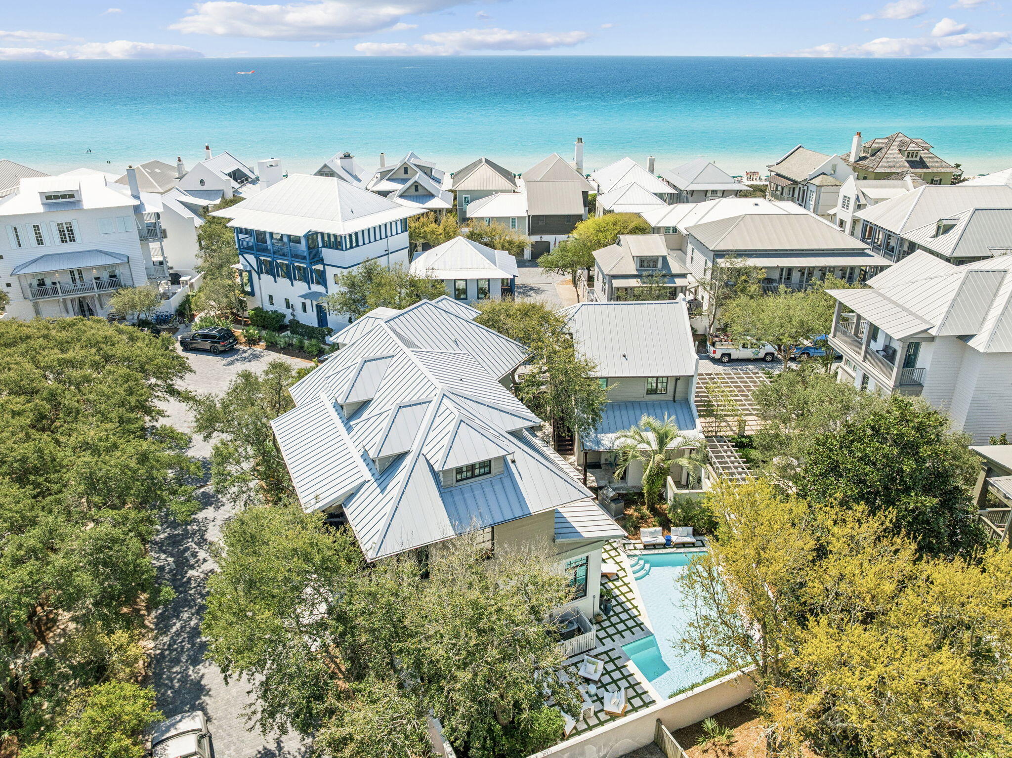 Positioned just 100 steps from the sugar white sands and emerald waters of the Gulf, 216 Round Road offers a rare opportunity to own a fully renovated and designer furnished estate in the heart of Rosemary Beach. Set on one of the community's most private corner lots facing a beautiful park, this Mediterranean inspired coastal residence blends timeless architecture with elevated modern updates, creating a home that is both refined and welcoming.
Spanning three levels in the main residence plus a beautifully updated carriage house, the property has undergone extensive renovations. A grand mahogany entry door opens to a dramatic great room featuring pecky cypress ceilings, Venetian plaster walls, and an open concept layout designed for seamless entertaining.