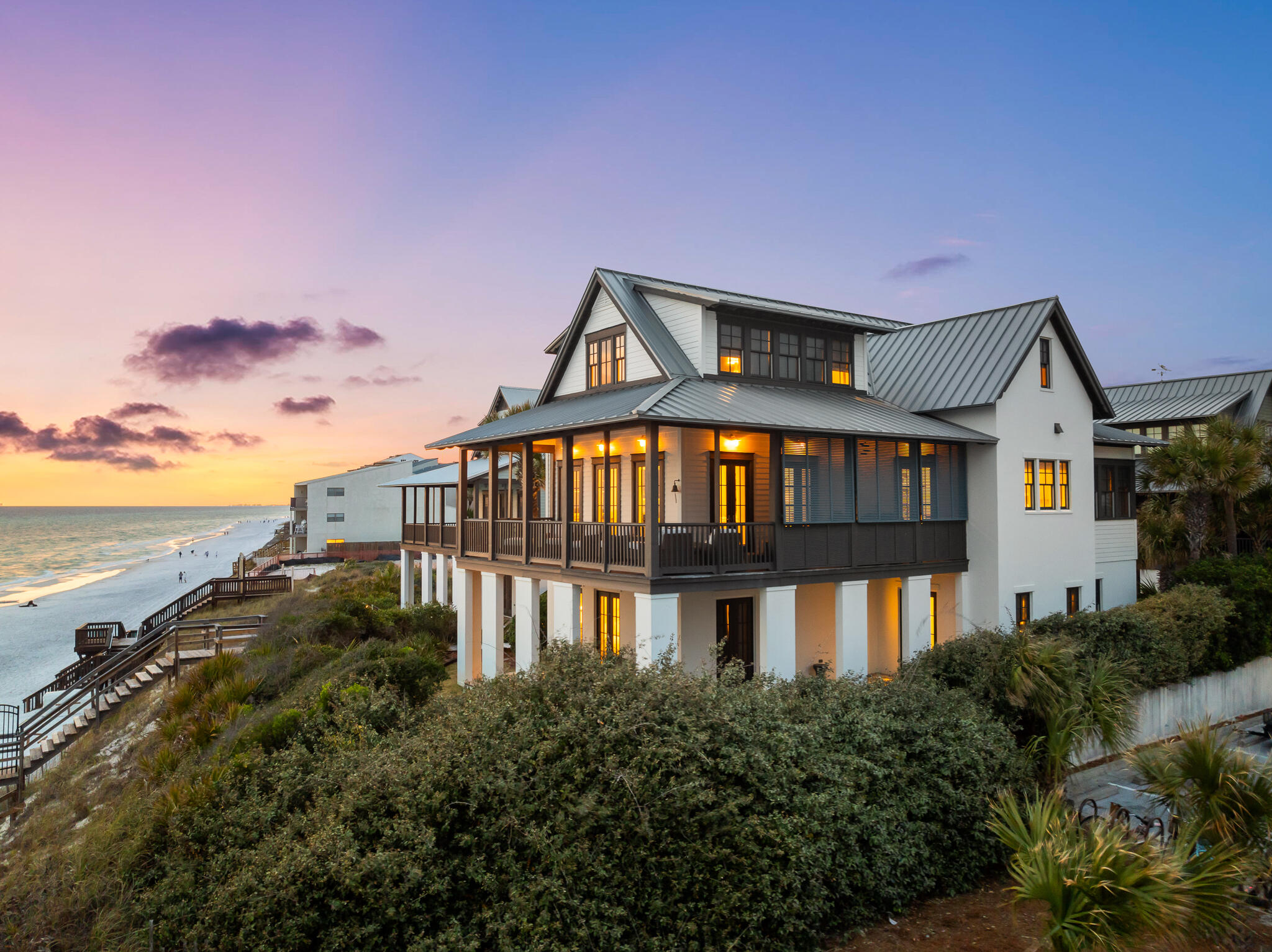 Positioned on 64' of private beach access and perched at over 30' above sea level among a rare stretch of 30A coastline within a non-rental, gated enclave, this Gulf-front home captures the essence of laid-back luxury in Blue Mountain Beach. Designed by the celebrated team at Urban Grace Interiors and built by Davis Dunn, the home reflects an unwavering attention to detail, where timeless materials and thoughtful craftsmanship create a residence that feels both refined and welcoming. Set across three spacious levels, the home offers five bedroom suites each with its own private bath and sweeping Gulf-views. On the first floor, a beautifully appointed primary suite opens to a covered terrace overlooking the dunes, offering a peaceful escape just steps from the beach. The third floor is dedicated entirely to a second, expansive primary suite, designed with privacy and scale in mind. Vaulted ceilings, panoramic water views, and a spa-like bath make it a true retreat.

At the heart of the home, the second floor features an open-concept kitchen, living, and dining area framed by floor-to-ceiling windows and Gulf vistas. Designed for effortless entertaining or quiet evenings at home, this central gathering space flows seamlessly onto a covered outdoor terrace equipped with a louvered privacy screen and built-in grilling station. A cozy media den, guest suite, and powder bath round out the floor, providing comfort and flexibility for guests.

Every detail of this home has been carefully considered from the custom millwork and designer lighting to the cohesive palette that nods to the surrounding landscape. The result is a home that feels elevated yet relaxed, where Gulf views are the backdrop to everyday living.

A private boardwalk with built-in seating offers direct access to the white-sand beach below, shared only with three other homes in this exclusive, rental-restricted community. Here, serenity meets convenience a rare combination along 30A.

Beyond the home itself, the location is one of the most desirable on the Emerald Coast. Blue Mountain Beach is known for its natural beauty, uncrowded shoreline, and a strong sense of community. Just a short stroll from the property, you'll find beloved local spots like Blue Mountain Creamery, Red Fish Taco, For the Health of It, and other cafés, boutiques, and restaurants that give this neighborhood its charm. The nearby bike path offers a scenic ride to Grayton Beach, Seaside, and beyond  making it easy to explore everything 30A has to offer.
Whether you're seeking a full-time residence or a generational retreat, this Gulf-front home represents an exceptional opportunity to own along one of the most coveted stretches of the Florida coast   where architectural integrity, natural beauty, and an easygoing lifestyle come together seamlessly.