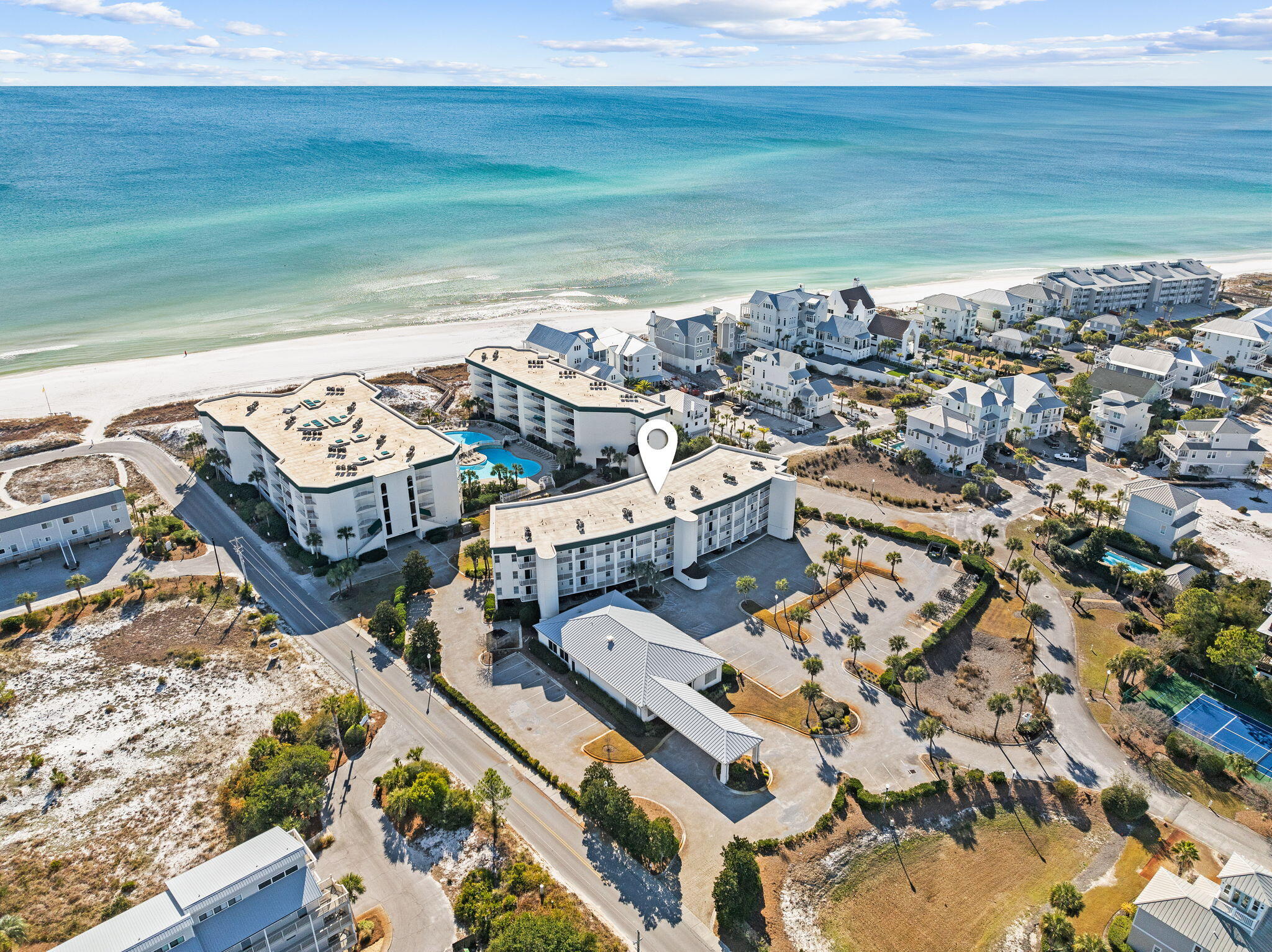 GULF FRONT CONDO with PRIVATE BEACH - Exterior has been totally renovated with white exterior paint and railings. (new pictures coming soon) Gorgeous top-floor, corner condo with 10 ft high ceilings and outstanding views of the Gulf, and a large resort pool! Completely remodeled in 2019, this condo is move-in ready, with Beach decor, new porcelain tile, and wood flooring for easy cleaning and durability. Kitchen features all-new soft-close cabinets, appliances, water heater in 2022, and HVAC in 2025.. Both owner and guest suite bathrooms have new walk-in showers with stylish beach glass tile, new vanities, new lighting, and new tile flooring. An expansive balcony off both the master and main living area makes for the perfect spot for morning coffee and entertaining groups. The corner top-floor unit features a guest bedroom with windows that are private and not on the walkway. This condo has one of the few covered deeded parking spaces that will transfer with the condo, and is located next to the stairs and close to the elevator for easy access. Located on the South side of 30A, this beautiful condo is in a highly desirable area with fine and casual dining, shopping, and entertainment, and Seaside, Seagrove, WaterColor, and Rosemary Beach are just a short distance away. This is your opportunity to own the Gulf view you desire and already beautifully renovated. Furnishings and everything are ready for you to make it your investment property or second home. All data and dimensions to be verified by buyer.