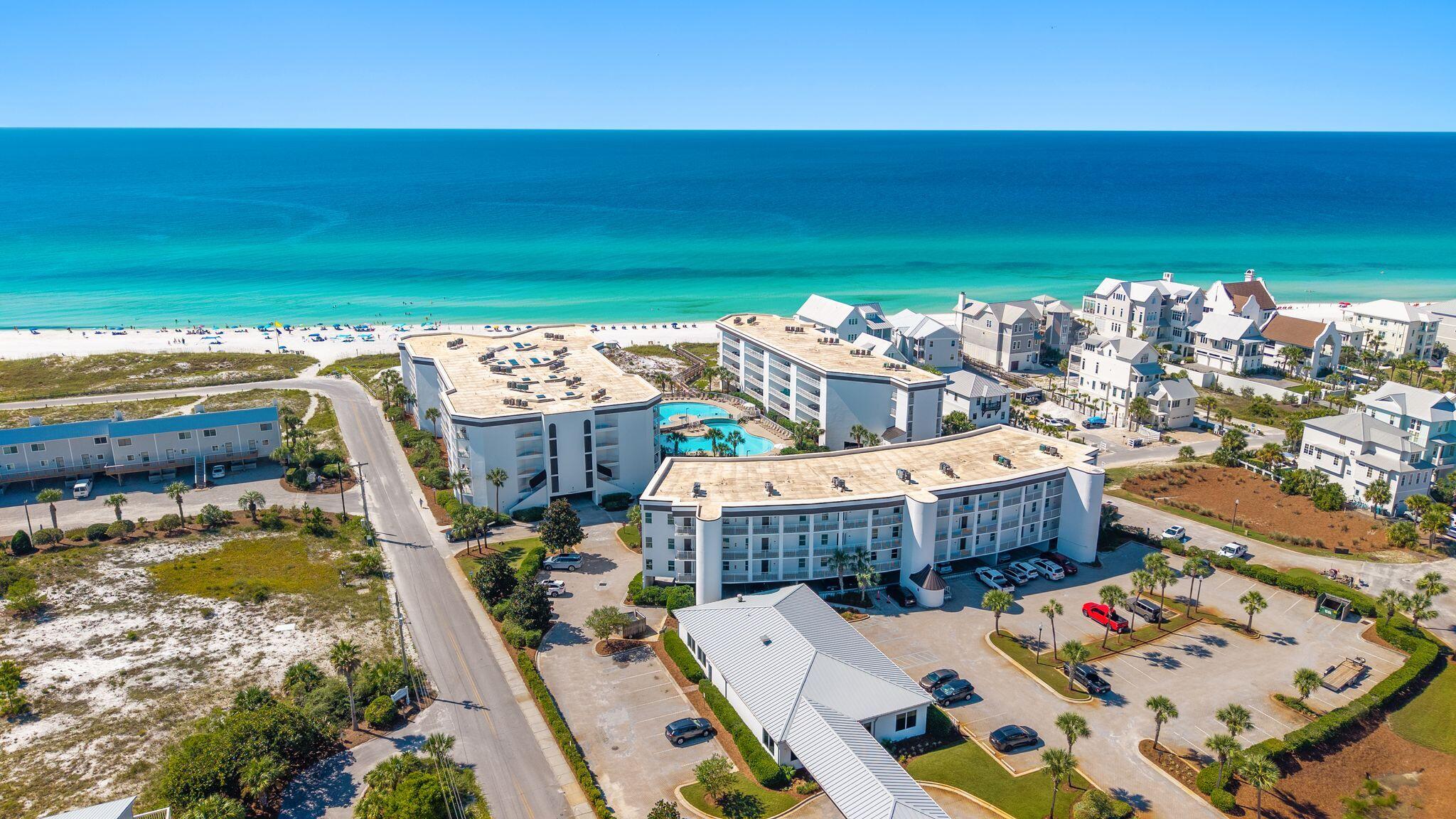 GULF FRONT CONDO with PRIVATE BEACH - Exterior has been totally renovated with white exterior paint and railings. (new pictures coming soon) Gorgeous top-floor, corner condo with 10 ft high ceilings and outstanding views of the Gulf, and a large resort pool! Completely remodeled in 2019, this condo is move-in ready, with Beach decor, new porcelain tile, and wood flooring for easy cleaning and durability. Kitchen features all-new soft-close cabinets, appliances, water heater in 2022, and HVAC in 2025.. Both owner and guest suite bathrooms have new walk-in showers with stylish beach glass tile, new vanities, new lighting, and new tile flooring. An expansive balcony off both the master and main living area makes for the perfect spot for morning coffee and entertaining groups. The corner top-floor unit features a guest bedroom with windows that are private and not on the walkway. This condo has one of the few covered deeded parking spaces that will transfer with the condo, and is located next to the stairs and close to the elevator for easy access. Located on the South side of 30A, this beautiful condo is in a highly desirable area with fine and casual dining, shopping, and entertainment, and Seaside, Seagrove, WaterColor, and Rosemary Beach are just a short distance away. This is your opportunity to own the Gulf view you desire and already beautifully renovated. Furnishings and everything are ready for you to make it your investment property or second home. All data and dimensions to be verified by buyer.