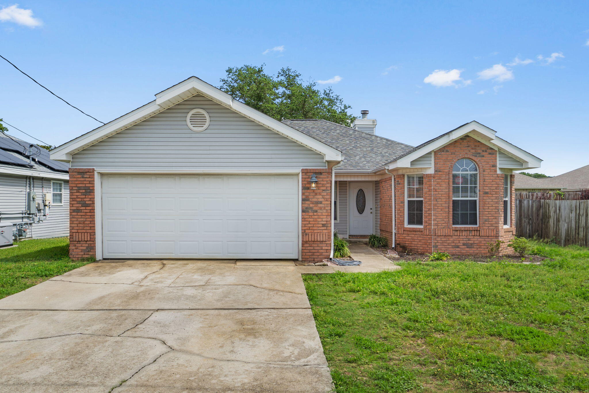 Welcome home to this perfectly located 3-bedroom, 2-bath residence in Mary Esther, just 5 miles from the front gate of Hurlburt Field and minutes from the area's beautiful beaches, shopping, dining, and everyday conveniences on a dead end street.

Major system updates provide peace of mind, including a NEW ROOF in 2025, electrical panel replacement in 2019, and a water heater that will be replaced prior to closing. HVAC was installed in 2014. 
Inside, you'll find wood-look laminate flooring throughout and a spacious living area highlighted by a stunning wood-burning fireplace featuring floor-to-ceiling stone accents and a custom wood mantle. 

The primary suite offers a recently renovated bathroom complete with a walk-in subway-tiled shower, updated fixtures, new flooring extending into the walk-in closet, and refreshed vanity finishes. Additional house updates include a full interior repaint, updated front door and exterior lighting, and a replaced garage door opener.

Outside, enjoy low-maintenance brick and vinyl siding, a covered back porch, and a privacy-fenced backyard.

Currently tenant occupied through June 30th. Tenant belongings have been digitally removed from listing photos.