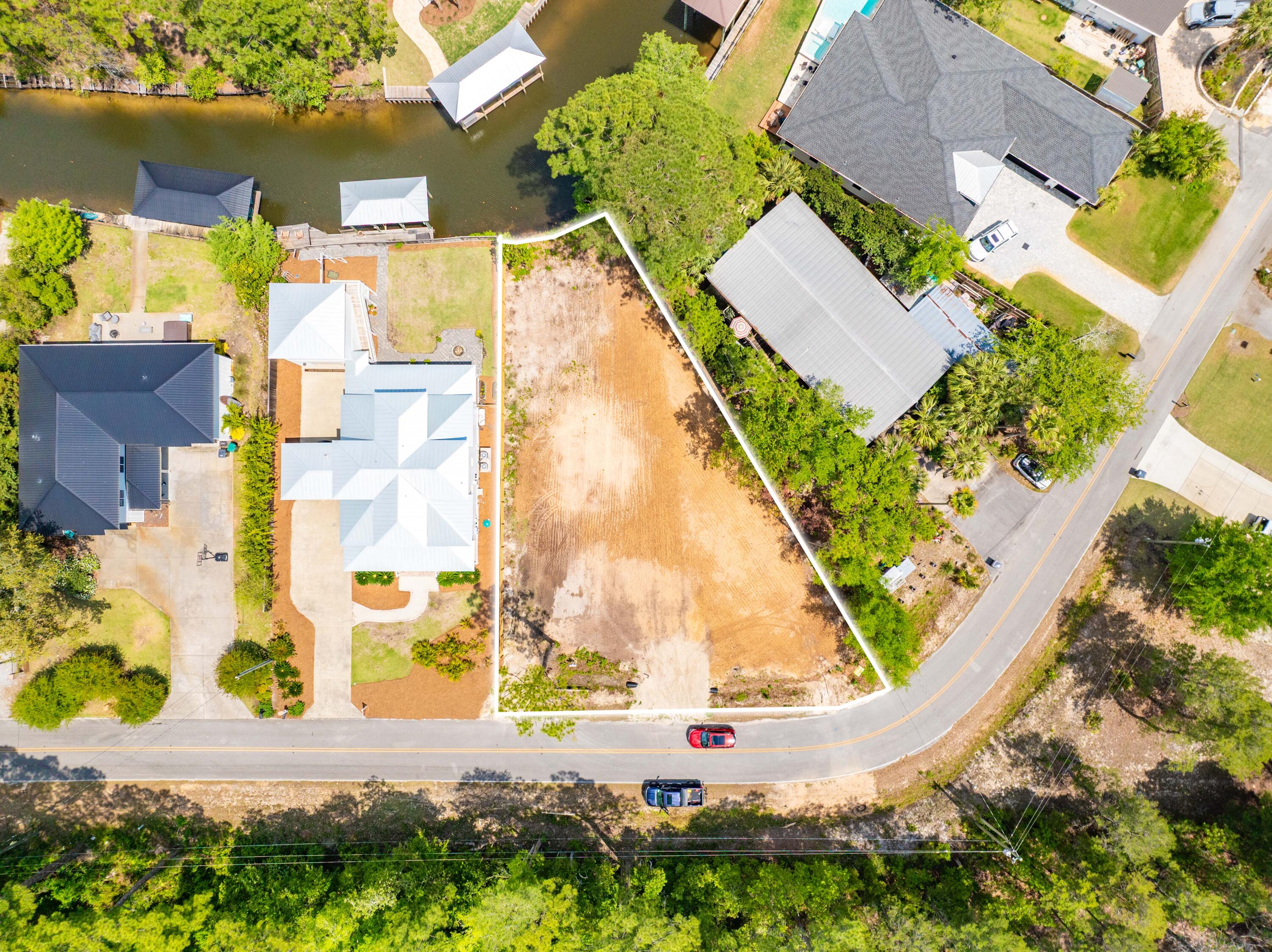 Canal-Front Lot in Point Washington, FL with 42' Frontage and Plans for a 4BR/3.5BA Home

This rare 42-foot canal-front homesite at 564 W Point Washington Rd in Santa Rosa Beach, FL is just minutes from Scenic Highway 30A and the Choctawhatchee Bay. The 0.258-acre parcel comes with plans for a 4-bedroom, 3.5-bath home that includes a dedicated office and a 2-car garage. These plans can be transferred with the sale, which could save the right buyer a lot of design time.

The current plans include 3,321 square feet of heated and cooled living space, along with 1,243 square feet of porches. The design makes the most of the canal frontage and natural setting. With direct canal access, this property is perfect for boating, kayaking, or paddleboarding in one of Point Washington's more private and relaxed neighborhoods near 30A.

Buyers should confirm the plan status, permit status, and all specifications with Walton County before closing. This is a rare chance to own canal frontage close to the world-class beaches of 30A.