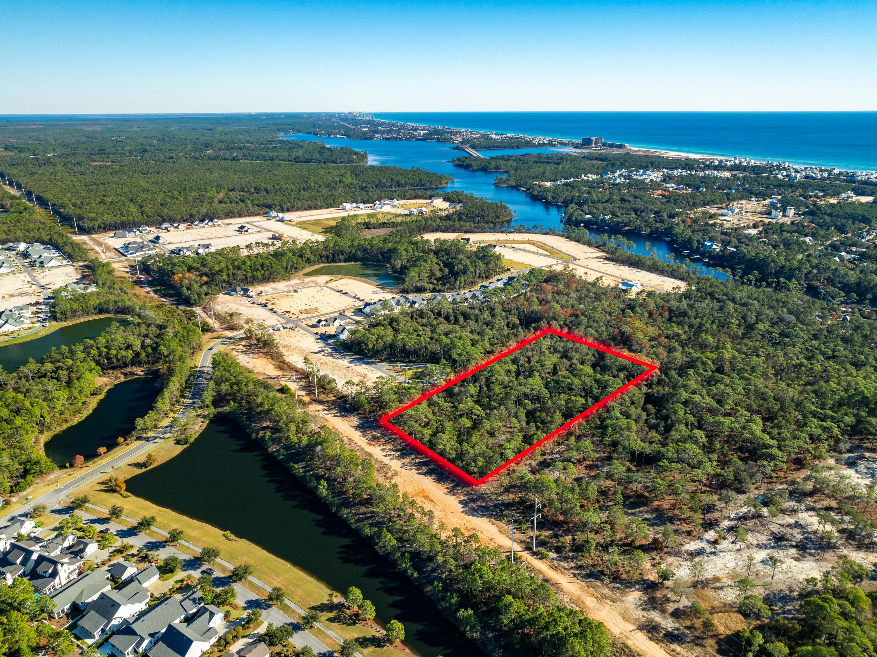 Residents will enjoy close proximity to the shopping and dining destinations of Rosemary Beach, Alys Beach, Seacrest, Inlet Beach, and 30Avenue, along with easy access to Scenic Highway 30A. Positioned along Northwest Florida's scenic Gulf Coast, the property is centrally located between the energy of Panama City Beach and the charm of nearby coastal communities. Situated in the highly sought-after Inlet Beach area, this expansive 5-acre parcel offers a rare opportunity adjacent to St. Joe's newest phase of the WaterSound Origins community. Zoned Conservation Residential, the property allows for up to two homes per acre, providing both flexibility and ample space for a thoughtfully designed development.  Ideally located, the property is just a short stroll from the peaceful waters of Lake Powell and a quick drive to the white sand beaches of the Gulf. The setting strikes a perfect balance between natural beauty and everyday convenience.