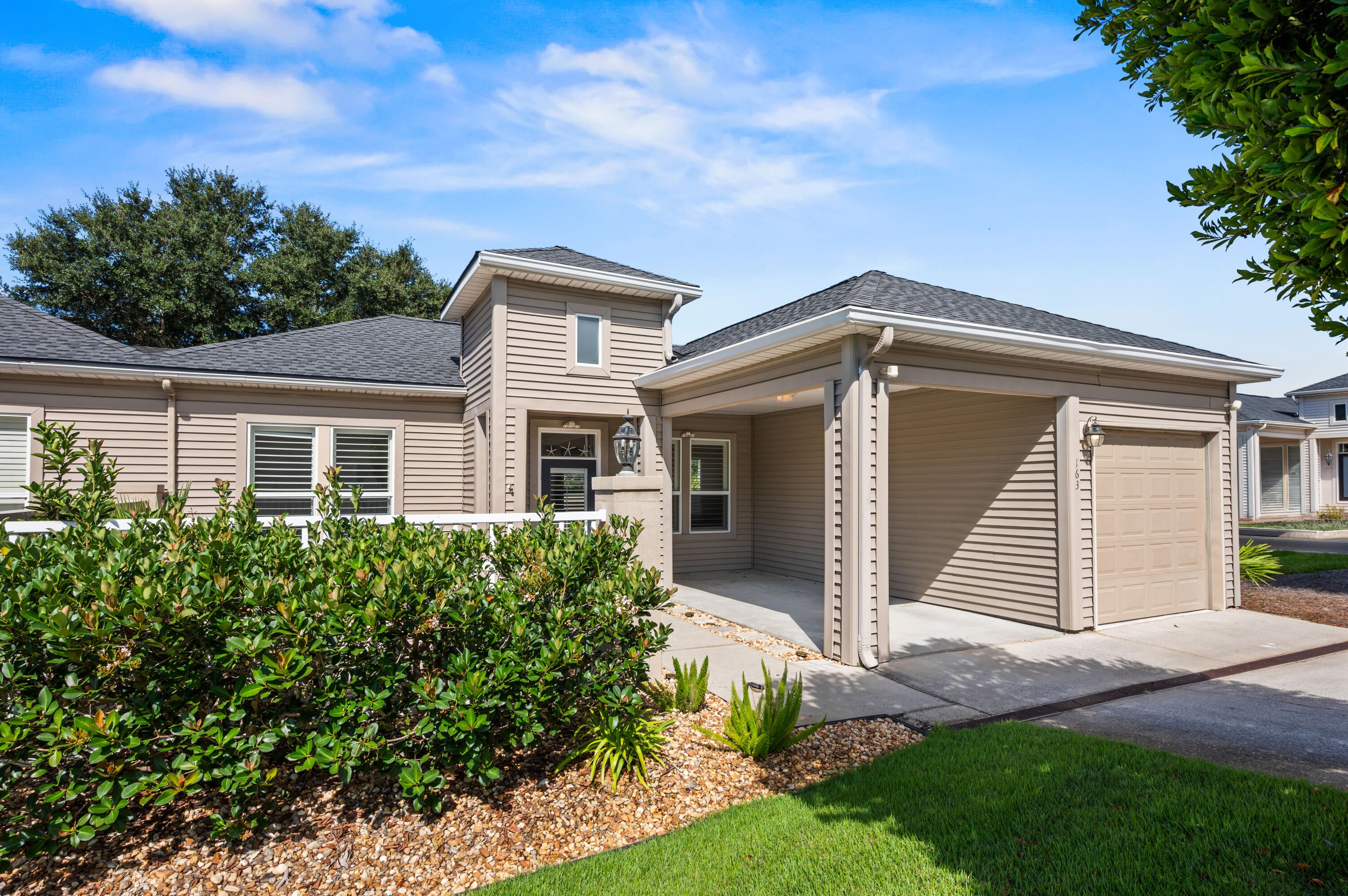 Welcome to 163 Courtyard Circle in Santa Rosa Beach, FL! Presenting a wonderful opportunity in an amazing location on the west end of 30A. Very close proximity to the beach, Santa Rosa Golf and Beach Club, and local 30A restaurants. Rental restrictions and ease of use make this the perfect unit to enjoy the 30A lifestyle with less work. The home lives larger than its 1,484 square feet. A walled paver courtyard gives you a true outdoor room, with space to dine, grill and gather around the fire table, and a gate onto the neighborhood path to the community pool. Inside, ten-foot ceilings, crown molding and columned openings frame an open dining and living space anchored by a shiplap fireplace with a reclaimed-wood mantel. Plantation shutters run throughout, wide-plank flooring ties the main level together, and French doors pull the courtyard into the living room. The kitchen has granite counters, white cabinetry, stainless appliances, a pantry and a breakfast bar. Both bedrooms are true suites, each with its own full bath, the primary adding a walk-in closet and a renovated. A covered breezeway connects the one-car garage to the entry courtyard at the front door. The Santa Rosa Golf Club is just steps away and the Dune Allen Beach Access is a half mile. No short-term rentals, which is exactly what keeps The Courtyards quiet and consistent year-round. All information is believed to be accurate but should be verified.