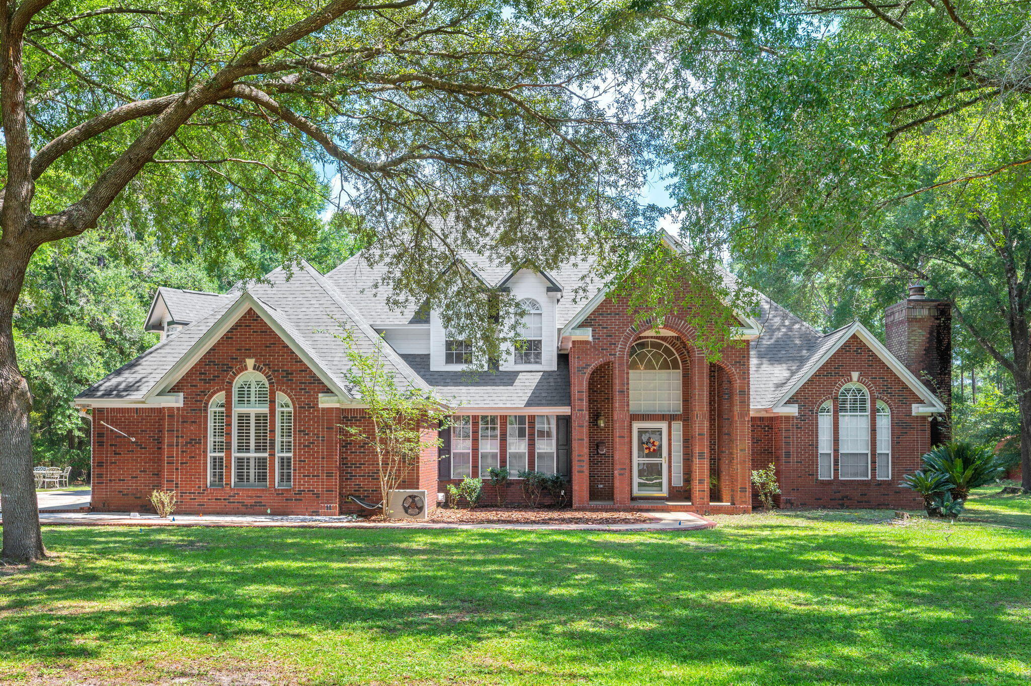 Welcome to this exquisite four-bedroom, 4.5-bath home situated on just over one acre, offering an impressive combination of luxury, space, privacy, and Florida living.

The main level features a spacious primary suite with a private sitting area and cozy fireplace, creating the perfect retreat. A formal dining area with a built-in wet bar is ideal for entertaining, while the open-concept kitchen flows seamlessly into the living area.

One of the highlights of this home is the huge family-sized in-ground pool, surrounded by a screened enclosure and offering an incredible space for swimming, entertaining, or simply relaxing and enjoying the Florida lifestyle. The spacious Florida room provides additional living and entertaining space and even includes a convenient dog-bathing area for your four-legged family members. Upstairs, each bedroom features its own private en-suite bathroom, along with charming window seats and generous walk-in closets. A convenient upstairs laundry chute adds another thoughtful touch to the home's design.

Outside, the property continues to impress with just over an acre of land, an RV pad, and a well-water sprinkler system. With its expansive family pool, generous living spaces, private bedroom suites, and unique amenities, this home offers plenty of room for everyone--inside and out. Roof replaced in 2023 as well as water heaters.