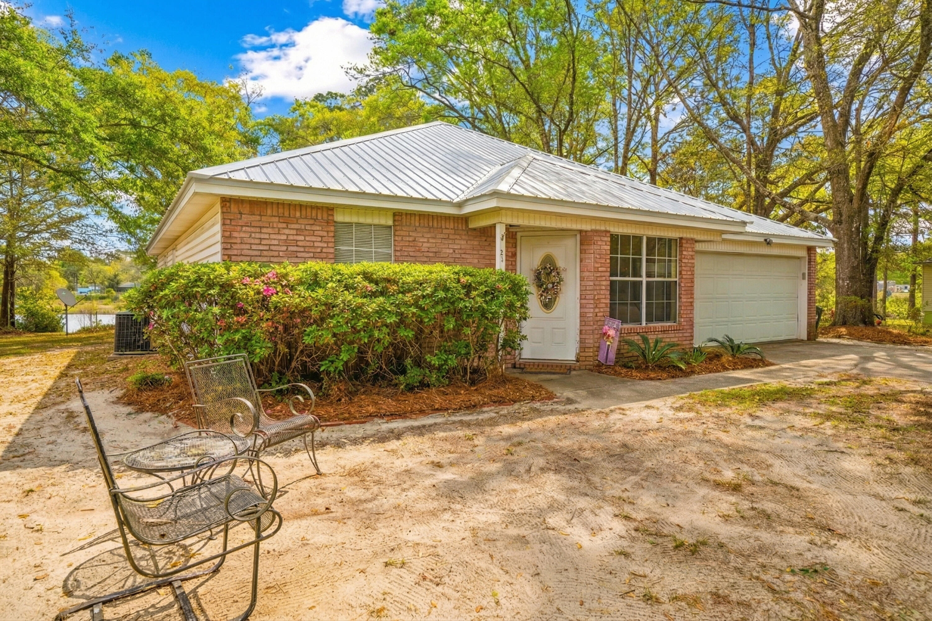 Price Reduced! Bring Offers! Tucked away on a quiet cul-de-sac, this all-brick 3-bedroom, 2-bath home offers 1,385 sq ft of peaceful lakefront living. With 221± feet on the water and a private dock, it's the perfect setting to unwind. The backyard is simply beautiful--shaded by mature oaks and complete with a fire pit for cozy evenings. The Florida room is a true highlight, and the primary bedroom features its own access for easy indoor-outdoor living. A serene retreat you'll love coming home to. Peaceful, private and move-in ready- this home is a rare find! Call to schedule your tour today!