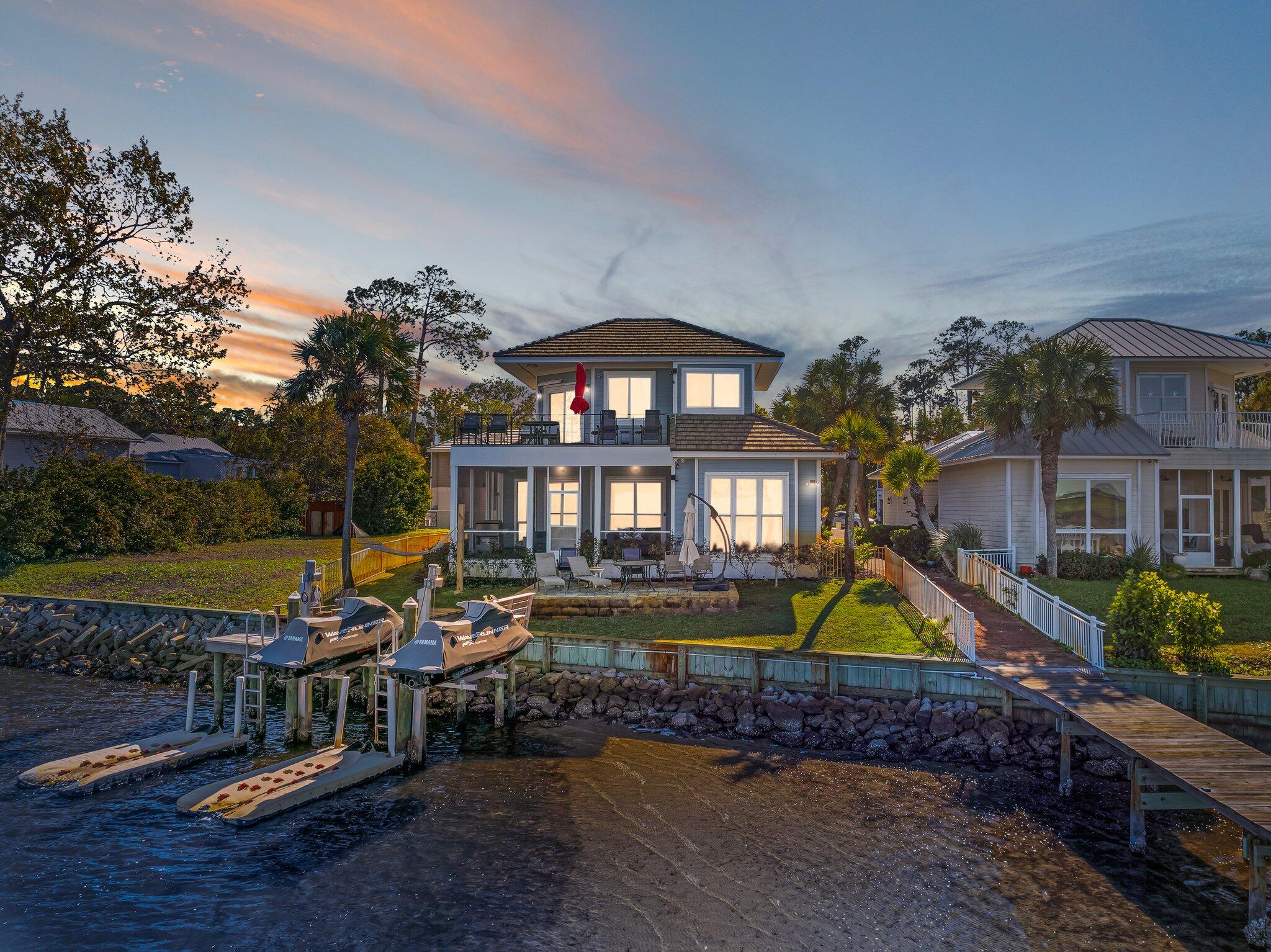 Bayside living reaches new heights at 38 Garden Bay Ct, a beautifully updated retreat tucked within the desirable Bayshores Gardens community of Miramar Beach. This fully furnished, open-concept home spans 1,810 square feet, offering three bedrooms and three bathrooms bathed in natural light and framed by mesmerizing waterfront views.

The heart of the home is a contemporary kitchen built for gathering, with generous counter space that makes hosting effortless. Expansive windows draw the shimmering water indoors, so whether you're perched at the breakfast bar or seated in the refined dining area, the scenery never fades. Just off the living space, a screened-in porch with newly constructed decking becomes your favorite spot to relax as the day winds down.

Water enthusiasts will be delighted by the private dock, complete with four locations for waverunners, brand new Sea-Doo Spark to use, and a dedicated boat slip--your gateway to endless days on the bay. Retreat to the master bathroom, where a brand-new jetted jacuzzi, hot tub awaits after a long afternoon on the water.

Beyond your doorstep, convenience abounds. Paradise Park sits just moments away for morning recreation and outdoor play, while Whole Foods Market and Silver Sands Factory Stores are only minutes north in Destin. Residents will appreciate the proximity to Destin High School, and beach access, dining, and shopping all fall within two easy miles. Bright, breezy, and thoughtfully appointed, this home captures the very best of relaxed coastal living. Come see it before it's gone.