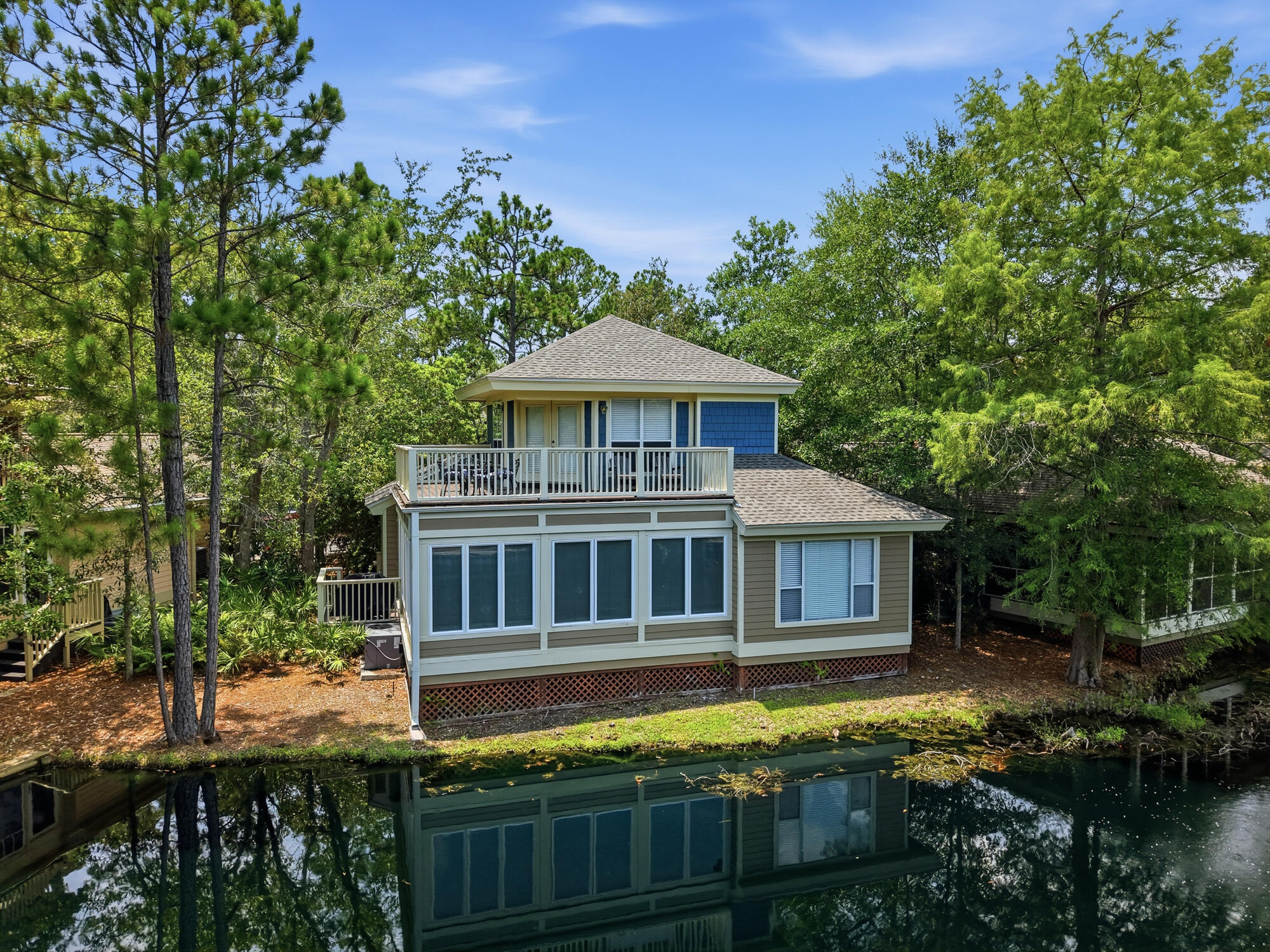 There is an unmistakable ease to life at 8857 Baypine Drive, where peaceful lake views, resort-style amenities, and the best of Sandestin come together in one exceptional setting. Located within the gated Sandestin Golf and Beach Resort, this beautifully maintained two-story residence offers a lifestyle centered around convenience, recreation, and the natural beauty of the Emerald Coast.

Spanning 1,968 square feet, the home features three bedrooms and three bathrooms, with a thoughtful floor plan that balances inviting gathering spaces with comfortable private retreats. Rich hardwood flooring flows throughout the main living areas, while expansive windows fill the home with natural light and frame tranquil views of the lake beyond.

The living and dining spaces transition effortlessly to a screened porch, creating a peaceful outdoor room where mornings begin with coffee overlooking the water and evenings wind down beneath the glow of sunset. Whether entertaining guests or simply enjoying the quiet surroundings, the home's connection to its outdoor setting is both effortless and inviting.
 Spacious bedrooms provide comfort and privacy, while the home's two-story design offers flexibility for everyday living. Short-term rentals are permitted, adding versatility to this exceptional property.

Adding to the home's appeal, a golf cart conveys with the purchase, making it easy to experience everything Sandestin has to offer. Cruise to championship golf courses, bayfront restaurants, boutique shopping, relaxing spas, the marina, or the resort's private beach access with the convenience that has become part of everyday life within the community.

Perfectly positioned in one of Miramar Beach's most sought-after destinations, 8857 Baypine Drive offers more than a home--it offers a lifestyle where lakefront tranquility, world-class amenities, and coastal convenience exist in perfect balance. From morning rounds of golf to waterfront dining and sunset rides through the resort, every day is an invitation to enjoy the very best of Sandestin.