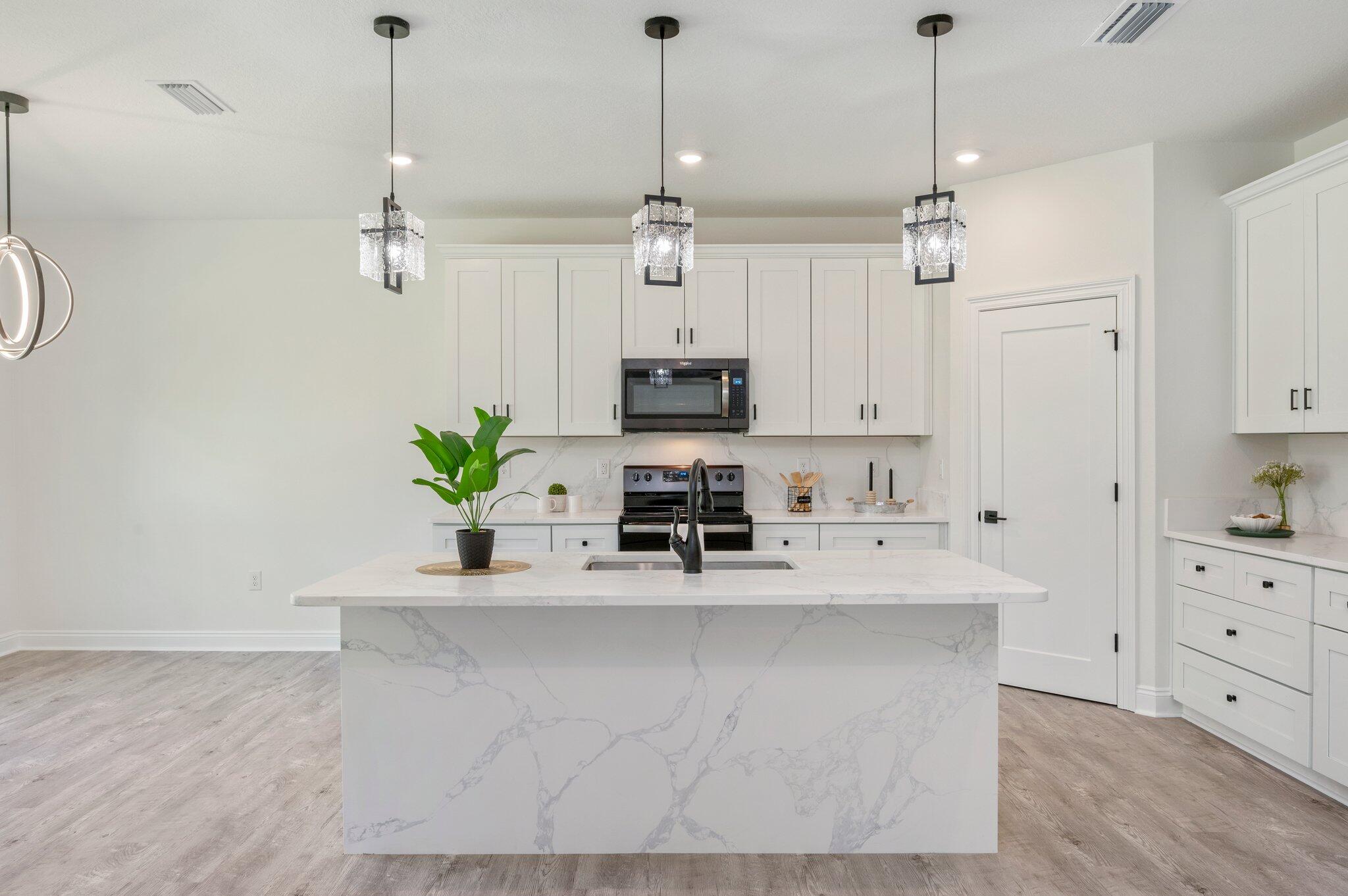When you've been searching for a home that feels CUSTOM without the custom price tag... THIS is the one. Welcome to HOMEWOOD ESTATES -- where timeless finishes, soaring ceilings, and bright open spaces come together to create a home that feels straight out of a designer magazine. 

From the moment you walk through the front door this NEW CONSTRUCTION beauty and the details start stealing the show...  The heart of the home? A STUNNING CHEF-INSPIRED kitchen featuring an OVERSIZED waterfall island, endless cabinetry, quartz-style countertops, custom lighting, matte black fixtures, stainless appliances, and a massive walk-in pantry that truly delivers. The entire living space is flooded with natural light and highlighted by elevated tray ceilings, recessed lighting, and warm luxury plank flooring throughout. Dream Kitchen

The open-concept living area feels GRAND yet welcoming, with expansive sightlines perfect for hosting gatherings. And just wait until you see the primary suite...

This private escape features tray ceilings, oversized windows, spa-inspired finishes, dual vanities, a luxurious soaking tub, MASSIVE tiled walk-in shower with niche detail, and a walk-in closet built to impress. 

Even the dining space feels elevated with designer lighting, oversized windows, and peaceful backyard view. 

MOVE-IN READY. DESIGNER FINISHES. MODERN LUXURY. ALL UNDER $400K.