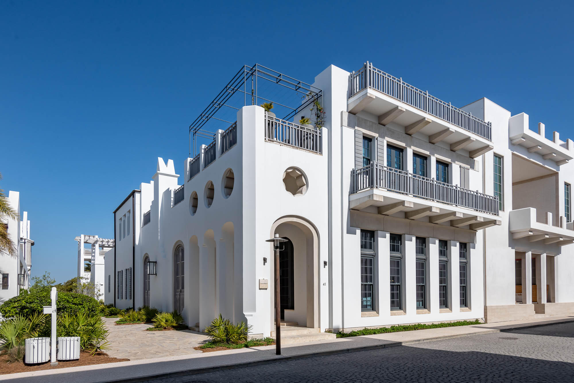Welcome to the prestigious and renowned home listing of 41 Kings Castle Court, designed by the award-winning architectural firm KVA Architecture. This luxurious residence is located south of the Scenic Highway 30A in the highly sought-after town of Alys Beach, offering easy access to the breathtaking Gulf of Mexico.  This exquisite home offers the perfect blend of elegance, comfort, and modern design, providing an unparalleled living experience.

Spanning an impressive 5,344 square feet of conditioned living space, this home boasts five bedrooms, each with its own private bathroom, providing ultimate comfort and privacy for you and your guests. The meticulously designed interior courtyard creates a tranquil oasis, complemented by an outdoor fireplace and custom brass water features, stainless beaded curtains, adding a touch of elegance to the outdoor living space.

As you step into this grand residence, you are greeted by the magnificent soaring, beamed plaster ceilings and an abundance of natural light. The spacious and open floor plan seamlessly connects the living, dining, and family areas, creating the ideal space for entertaining guests or spending quality time with family.

The gourmet kitchen is a chef's dream, featuring top-of-the-line appliances, custom cabinetry, and a large center island. A scullery is located adjacent to the kitchen to complement.  Family and friends will not be disappointed when engaging in the experience of this home. 
The primary bedroom on the first level is a true masterpiece, featuring its own private courtyard adorned with four majestic Washingtonian Palm trees. A custom copper lantern hangs above a serene water feature, creating a captivating ambiance for those full moon evenings. The courtyard seamlessly separates the bedroom and bathroom, offering stunning views from both spaces having slider doors allowing Gulf breezes to flow.  The large bathroom features custom built concrete vanities, soaking tub, with custom plumbing fixtures.  The primary custom-built bed is crafted in plaster further stating this home's custom features.   

A secondary primary bedroom awaits on the second floor, accompanied by three additional guest bedrooms, each boasting their own private bathrooms. The secondary primary hosts a private balcony showcasing water views captivated by numerous east & west windows transcending the suns light.  The second level hallway opens to a magnificent roof terrace, complete with a summer kitchen and beverage center, perfect for entertaining family and friends. For the ultimate in luxury, you can take a few steps up to the third roof terrace, where a rooftop swimming pool awaits, providing breathtaking views of the Gulf of Mexico.

This home is truly a work of art, showcasing intricate and unique designs that set it apart from any other. The barrel ceilings adorned with plaster and decorative lighting create an aesthetic scene that is unparalleled. A media room is incorporated for those days to stay in after too much sun. 

Adding to the allure of this magnificent home is its prime location, opening to Palmera Park Green. This not only enhances the overall aesthetic appeal but also adds to the architectural design, creating a harmonious blend of nature and luxury.