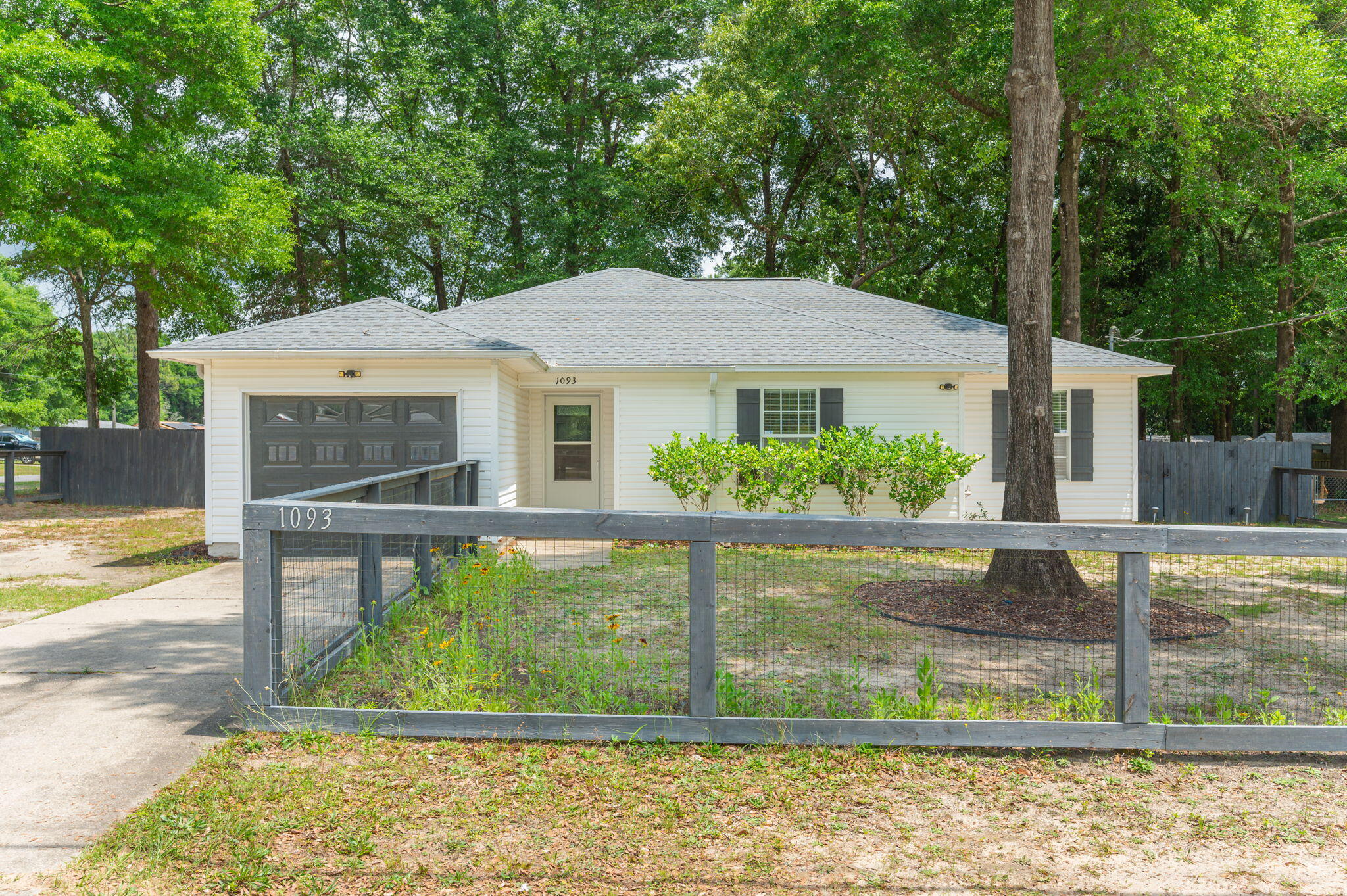 CHECK OUT THAT SHED OUT BACK! This 3/2 is situated on a spacious .33 acre lot! Inside, you'll find durable LVP flooring and tile along with beautiful butcher block countertops throughout the home, a stunning tile backsplash in the kitchen, and tasteful shiplap accents in both bathrooms. The open and inviting layout is perfect for everyday living and entertaining. Step outside to enjoy the fenced backyard with plenty of room for pets, play, or gardening. A detached garage/workshop provides excellent space for storage, hobbies, or projects. This property combines character, functionality, and outdoor space!