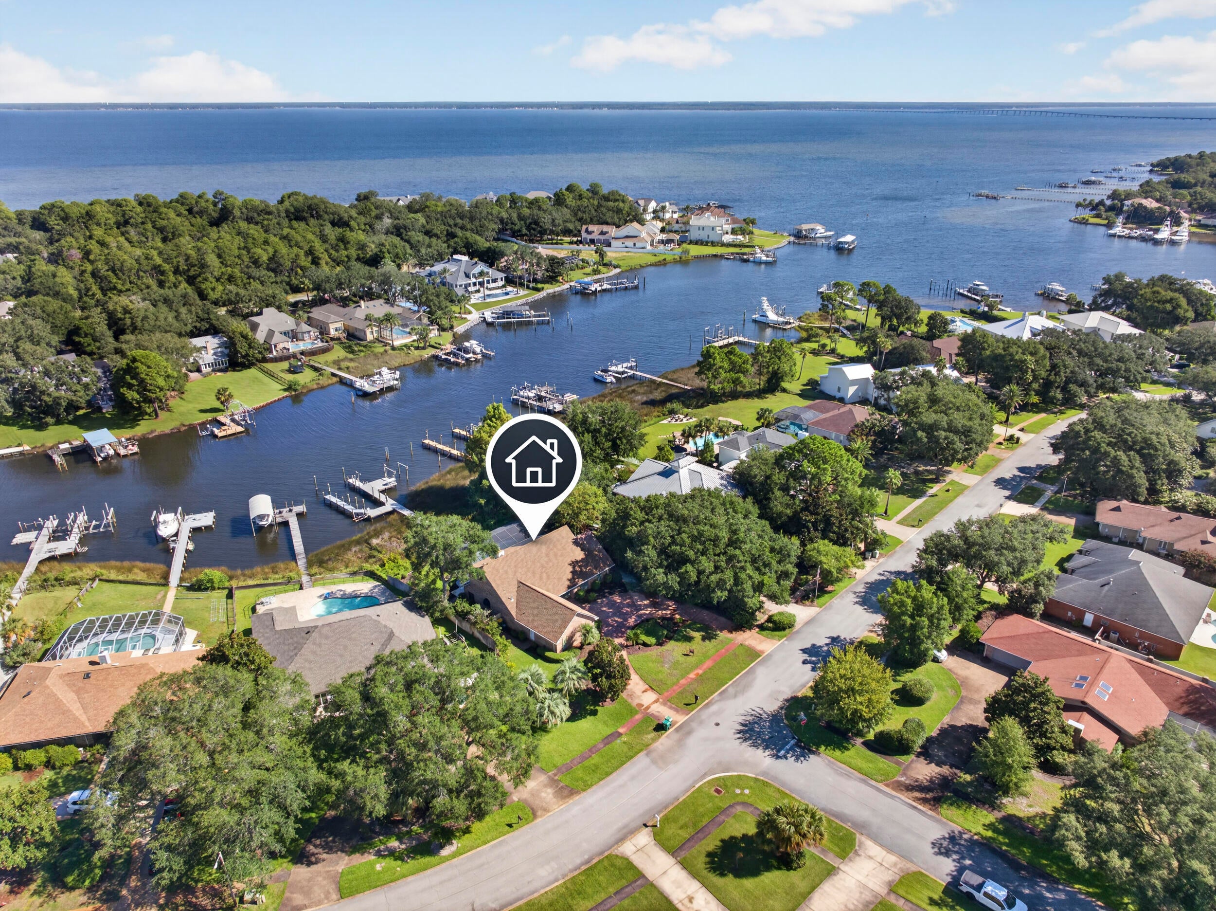 Deepwater Boat Slip!
136 Indian Bayou Dr. is a 4BR, 3.5BA waterfront home in the desirable Indian Bayou neighborhood with prized deepwater access. A standout feature of the property is its substantial dock and boat slip, capable of accommodating a 45-50 ft. boat, with additional dockage for multiple boats and other watercraft. The dock also features a large deck and fish-cleaning station. A designated No Wake Zone begins at the outer edge of the property, an especially desirable feature that reduces passing boat wakes at the dock and along the shoreline while still providing convenient access to Choctawhatchee Bay and the Gulf.

The heartbeat of the home is the great room which is a welcoming gathering place and a central access point to the kitchen, two dining areas the screened enclosure - which includes a swimming pool - outdoor covered kitchen with large counter/bar in an relaxing waterfront setting.  

The kitchen adjoins the breakfast/dining area and features, an island with smooth cooktop, breakfast bar, built-in menu desk, and stainless appliances. A separate formal dining room provides additional entertaining space. 

The first-floor primary suite accesses the pool deck.  Primary suit bath features double-sink vanities, garden tub, separate roll-in shower, 2 linen closets and a separate walk-through closet. Crown moulding is featured in all 4 bedrooms. The three full baths have upgraded showers or shower/tub combinations. The living room and primary suite open to the large, screened pool lanai overlooking the dock and Indian Bayou. The outdoor living area includes an outdoor kitchen and convenient half-bath.

Recent improvements include fresh interior and garage paint, new carpet, a new garage door & lift, new decking on a portion of the dock. Additionally, a Generac natural gas generator, exterior window shutters, central vacuum system, circular driveway with 7+ car parking and unfinished but hard floored attic for additional storage.

Indian Bayou is an established waterfront and golf course neighborhood, situated along the boat friendly waters of Indian Bayou, with access to Choctawhatchee Bay, the Intracoastal Waterway and the Gulf of America through East Pass.

This property is ideal for homeowners who want to enjoy the boating and golfing lifestyle in Destin.