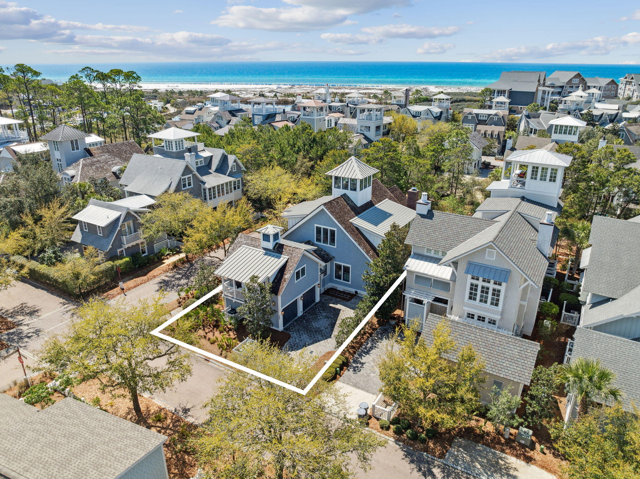 Totally remodeled Watersound Beach home with room for all your family and friends has 6 BRS in the main house, 2 on the main floor including the primary suite with 4 Ensuite Bedrooms Upstairs is ready to call your own!  You will find an additional king bed in the carriage house which has a full kitchen. The home boasts high-end finishes, quartz and quartzite countertops, and a brick fireplace. Upstairs and downstairs living areas provide room for everyone to spread out.  The kitchen is well-planned with high-end appliances and an island with bar stools. Enjoy outdoor living on the porch with retractable screens. Privacy is assured as the corner lot backs onto a nature conservation area. There is so much more!