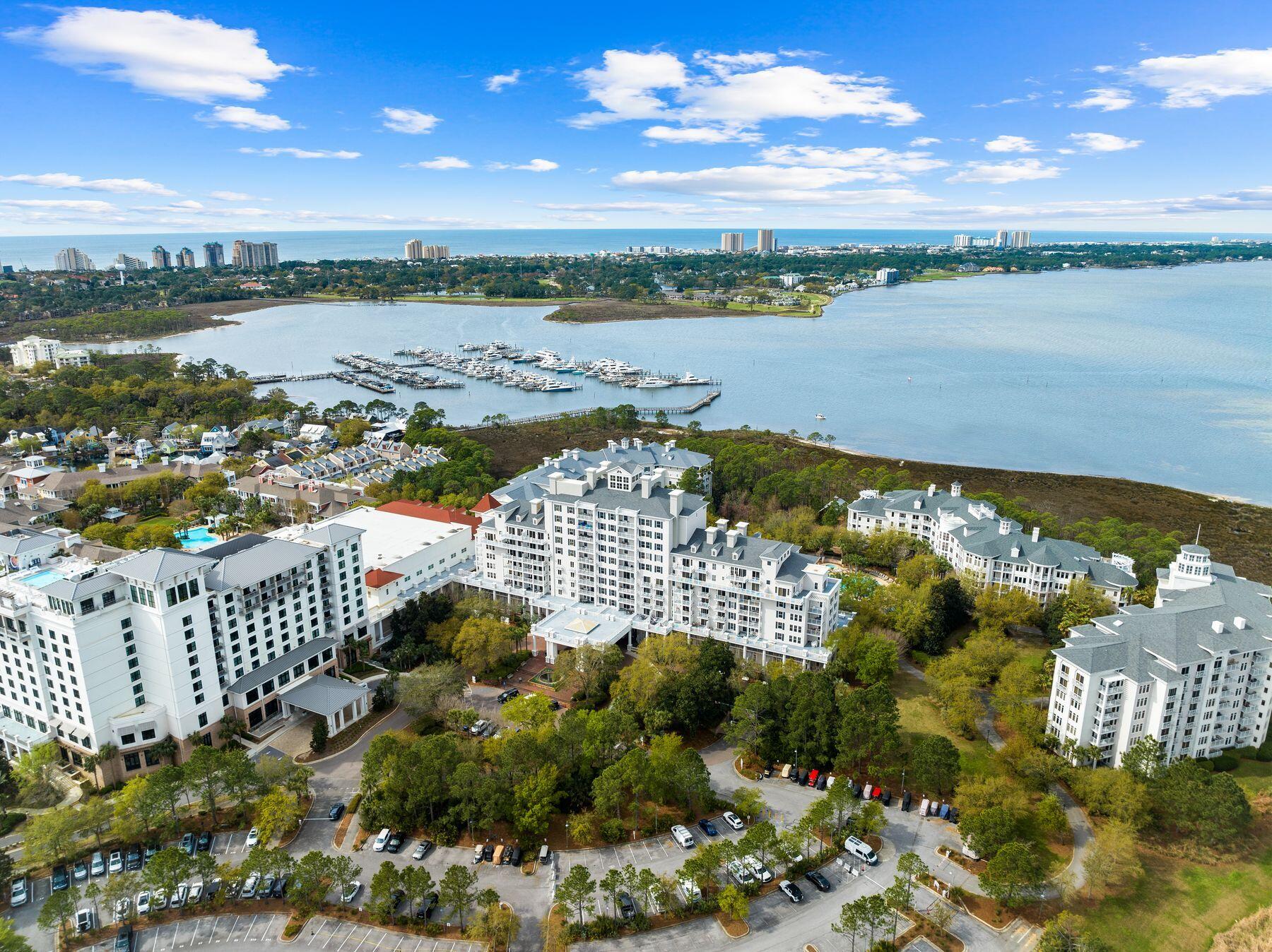 The lowest priced furnished 2BR with a NEW HVAC in 2026 in The Grand Sandestin, a popular conference center located in the bustling pedestrian village at the Village of Baytowne Wharf. A light and bright coastal decor encourages relaxed living inside a 10th floor penthouse level retreat with unparalleled panoramic views of the bay, peaceful sunrises, the golf course and more. A spacious balcony of over 107 square feet makes outdoor living enjoyable. Sandestin projects rentals of up to $53,969 annually based on similar rental units, but this unit has never been rented and is meticulously maintained as a primary residence. With only four units occupying this exclusive floor, privacy and tranquility are assured, and there are only five units with this floor plan. Providing an intimate escape amidst Baytowne Wharf vibrant ambiance. This exceptional residence, presents an unparalleled opportunity for discerning buyers seeking a second home, an investment property, or a primary residence with the added allure of personalization. The heart of the home is a spacious and luminous open-concept layout seamlessly connecting the kitchen, dining area and living room, creating an inviting space ideal for lavish entertaining. Modern conveniences abound, with stainless steel appliances including a new refrigerator and professionally painted cabinets in 2025. A gourmet kitchen and sleek charcoal granite counters providing both style and functionality. A laundry space sized perfectly for a stacked front loading washer and dryer is tucked away in a closet off the kitchen. This turnkey residence boasts an array of upgraded amenities, including custom window coverings, an electronic digital lock on the entry door for added security and additional electrical outlets strategically placed for enhanced convenience. It also had fresh paint including walls, trim and ceilings in 2023. Ensuring utmost comfort and functionality, the windows in the bedrooms and living areas have been expertly maintained to allow seamless operation, while new window screens have been installed, allowing for refreshing cross-breezes to permeate the space. An underground garage space is assured as well as storage cage in the garage for outdoor gear. Beyond the confines of this exquisite residence, residents of the Grand Sandestin are invited to indulge in a wealth of luxurious amenities, including a heated pool and hot tub for relaxation, a fully-equipped fitness center for maintaining an active lifestyle, and a convenient commercial laundry room for handling larger items. Residents will enjoy privileged access to an array of resort amenities and recreational activities that make Sandestin a coveted destination for all seasons and all ages. Meet the Sandestin beach tram at The Grand Sandestin porte cochere for a quick and easy ride to the beach. In the Village of Baytowne Wharf, residents can explore a diverse array of seasonal events, dining, shopping, and entertainment options, ensuring there's always something to delight every palate and preference. Sandestin Golf and Beach Resort stands as a beacon of luxury and leisure along Florida's Emerald Coast, spanning over 2,000 acres and encompassing more than 70 unique neighborhoods, each offering its own distinct charm and character. From pristine beaches, multiple day spas, championship golf courses, a world-class tennis center and year-round events at the Village of Baytowne Wharf, Sandestin offers an unparalleled array of amenities and activities to suit every lifestyle and preference.