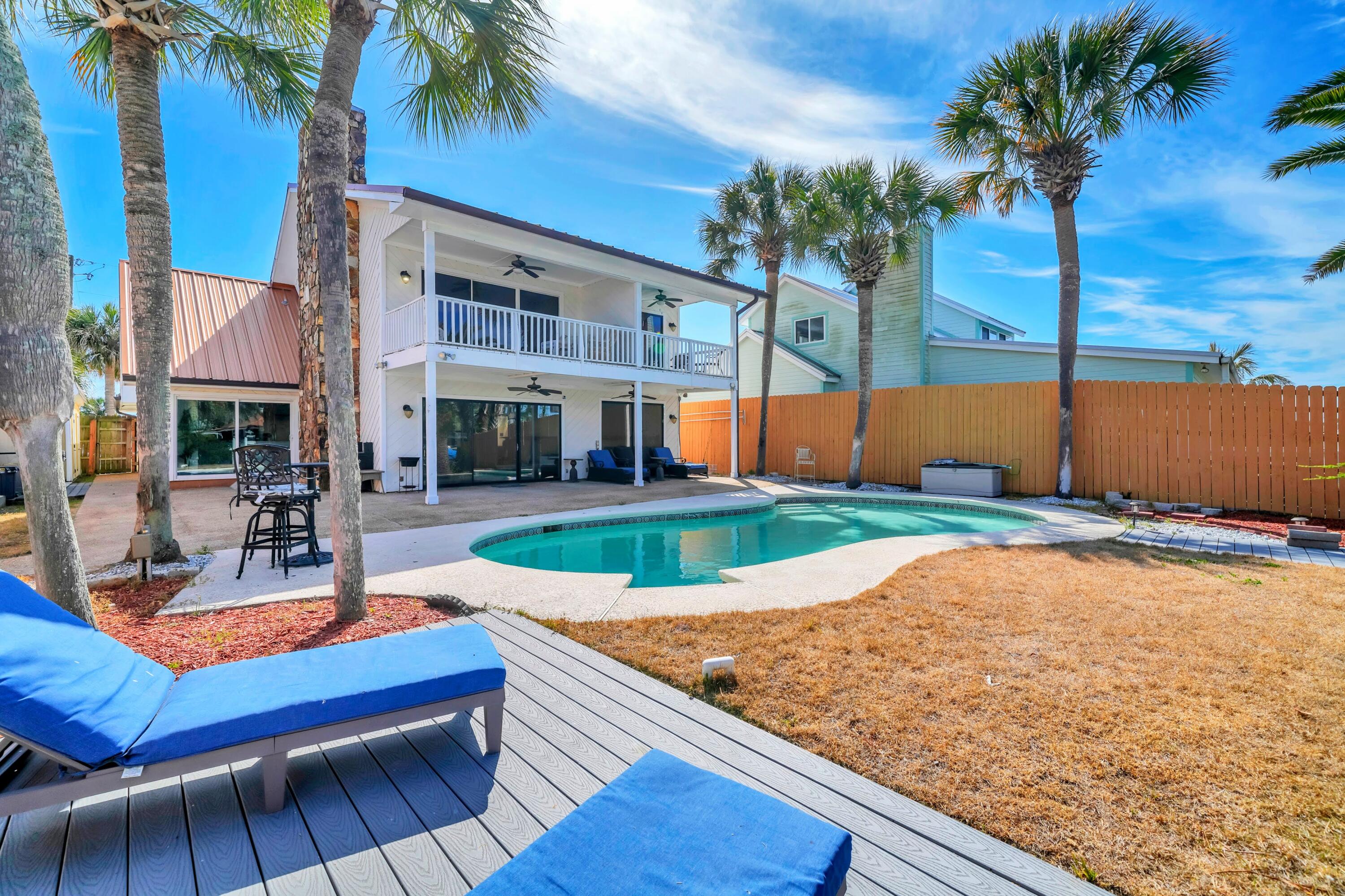 Experience the ultimate waterfront lifestyle with this fully remodeled coastal retreat on Grand Lagoon! Ideally positioned just minutes from the Gulf, this exceptional property offers a rare combination of modern luxury, double boat slip deep-water access, and outstanding short-term rental potential, all with no HOA restrictions. Thoughtfully renovated from top to bottom, the home features 5 bedrooms and 4 full bathrooms, including a spacious converted garage that serves as a private fifth bedroom with its own en-suite full bath. This flexible space can also function as a game or hobby room, making it ideal for maximizing rental occupancy and guest experience. The layout is well designed with two bedrooms on the first floor and the primary suite plus two additional bedrooms on the second level. Upon entering, the bright, contemporary design showcases fresh paint, updated lighting, and stylish fixtures throughout. New flooring flows seamlessly across the home with no carpet, creating a clean and low-maintenance environment ideal for both full-time living and high-traffic use. The fully redesigned kitchen is a standout, featuring white cabinetry, sleek countertops, and brand-new appliances that offer both style and functionality. Two of the three upstairs bedrooms feature private balconies with water views. Plus the primary bath has a jacuzzi tub and separate shower. Outdoors is resort-style living at its finest! The backyard is built for entertaining, complete with a gunite pool, relaxing spa, and multiple levels of newer Trex composite decking all with lagoon views. For the boating and water enthusiasts, this property is exceptionally well equipped with deep-water frontage and an incredible covered dock! One side features a 40' x 20' roof over a 24,000 lb boat lift that can accommodate approximately a 35' boat. The second dock includes a 16' x 24' roof over a 12,000 lb lift suited for up to 21'. Two jet ski float pads provide additional convenience and storage. This convenient location provides easy access to St. Andrews Bay, Shell Island, and the Gulf. Additionally, the home has already been connected to city sewer, which is both expensive and rare in the lagoon area. Situated on a quiet stretch of South Lagoon Drive and only a few blocks from the area's renowned beaches, Rick Seltzer Park, and multiple dining options, this property is ideally positioned to capitalize on Panama City Beach's strong vacation rental demand. Whether utilized as a primary residence, second home, or income-producing investment, this turnkey waterfront property delivers exceptional versatility and value. Schedule your showing today. A walk-through video is available.