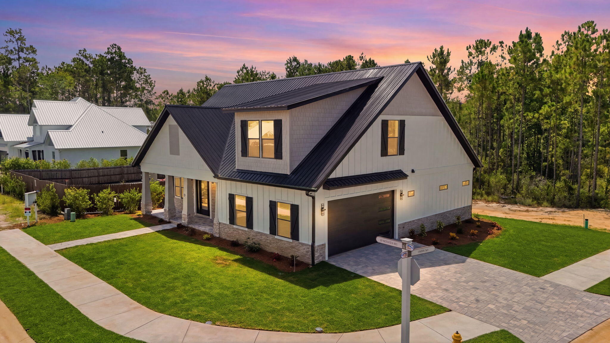 Welcome to modern coastal elegance in the Bear Creek community. This brand-new custom build seamlessly blends high-end architectural design with casual, everyday comfort. From the moment you walk through the door, you're greeted by bright, sun-filled living spaces, light oak-style flooring, and luxury finishes. 

The chef's kitchen is designed to be the heart of the home, featuring custom white and wood-tone cabinetry, brushed gold hardware, a pot filler, a geometric mosaic backsplash, and an expansive island anchored by designer pendant lights. 

The open main living area centers around a striking floor-to-ceiling fluted fireplace feature and opens through oversized sliding glass doors directly onto a quiet, private screened-in porch offering the perfect spot for morning coffee or evening wine with views of peaceful surrounding greenery.

Designed for maximum versatility, the home includes a dedicated main-level office space alongside a secondary upstairs flex loft with custom slat wall detailing--ideal for a play area or a media room. 

The spa-inspired primary suite serves as a luxury retreat, boasting a custom walk-in closet system and an ensuite bath complete with dual fluted vanities and a floor-to-ceiling marble glass shower with dual shower heads. 

Beyond the home's striking exterior curb appeal, accented with black metal roofing, impact windows & doors, board-and-batten siding, stone pillars, and a paver driveway. Bear Creek offers a vibrant resort lifestyle ... Enjoy premier neighborhood amenities including a resort-style pool, fitness center, tennis and pickleball courts, basketball court, playground, and scenic walking trails. Schedule your private tour today to experience this custom masterpiece
