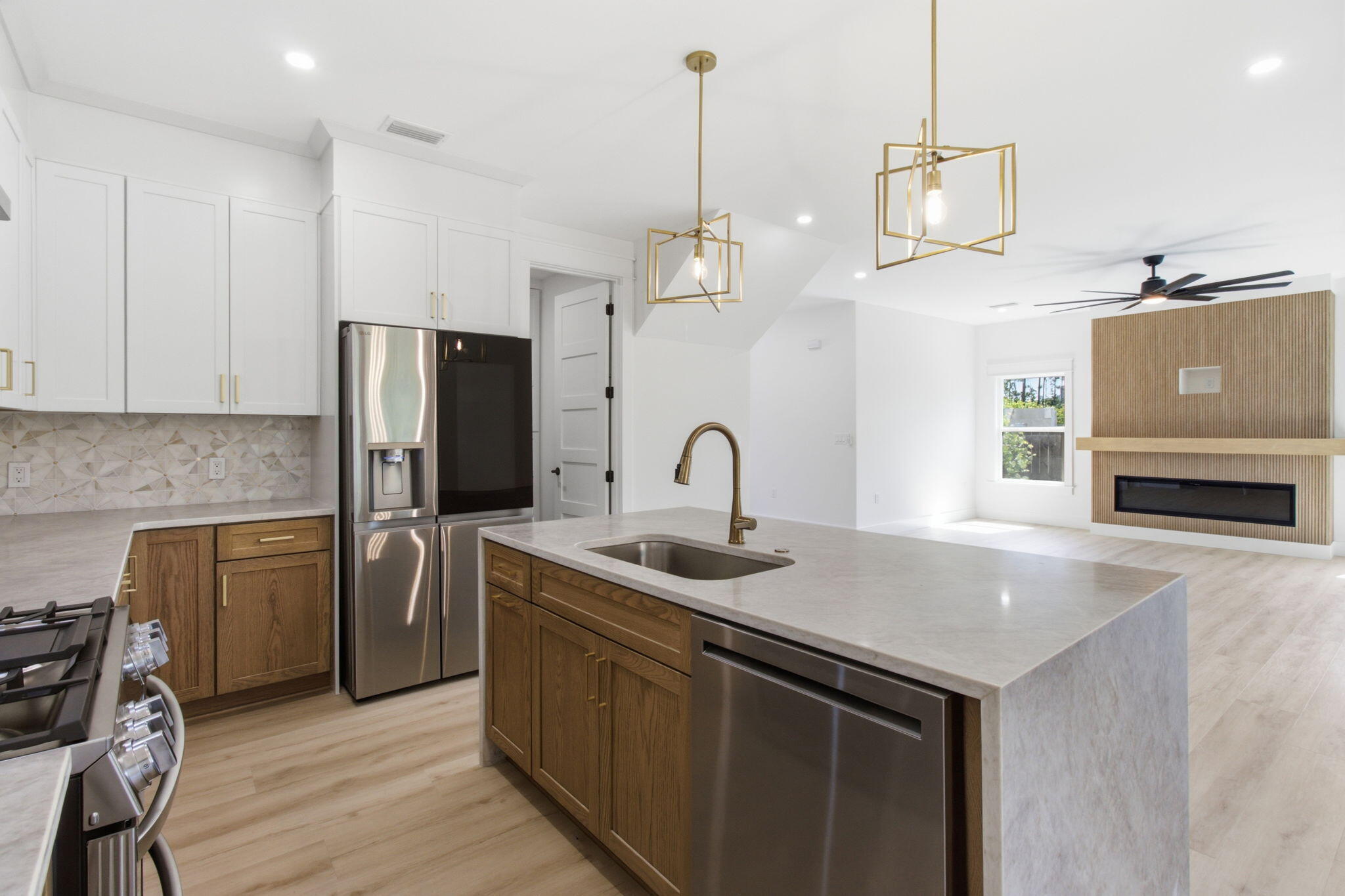 Welcome to modern coastal elegance in the Bear Creek community. Up to $5,000 Flex Money when using Preferred Lender. This brand-new custom build seamlessly blends high-end architectural design with casual, everyday comfort. From the moment you walk through the door, you're greeted by bright, sun-filled living spaces, light oak-style flooring, and luxury finishes. 

The chef's kitchen is designed to be the heart of the home, featuring custom white and wood-tone cabinetry, brushed gold hardware, a pot filler, a geometric mosaic backsplash, and an expansive island anchored by designer pendant lights. 

The open main living area centers around a striking floor-to-ceiling fluted fireplace feature and opens through oversized sliding glass doors directly onto a quiet, private screened-in porch offering the perfect spot for morning coffee or evening wine with views of peaceful surrounding greenery.

Designed for maximum versatility, the home includes a dedicated main-level office space alongside a secondary upstairs flex loft with custom slat wall detailing--ideal for a play area or a media room. 

The spa-inspired primary suite serves as a luxury retreat, boasting a custom walk-in closet system and an ensuite bath complete with dual fluted vanities and a floor-to-ceiling marble glass shower with dual shower heads.  Beyond the home's striking exterior curb appeal, accented with black metal roofing, impact windows & doors, board-and-batten siding, stone pillars, paver driveway and ..
 walkway. Bear Creek offers a vibrant resort lifestyle. Enjoy premier neighborhood amenities including a resort-style pool, fitness center, tennis and pickleball courts, basketball court, playground, and scenic walking trails. Schedule your private tour today to experience this custom masterpiece