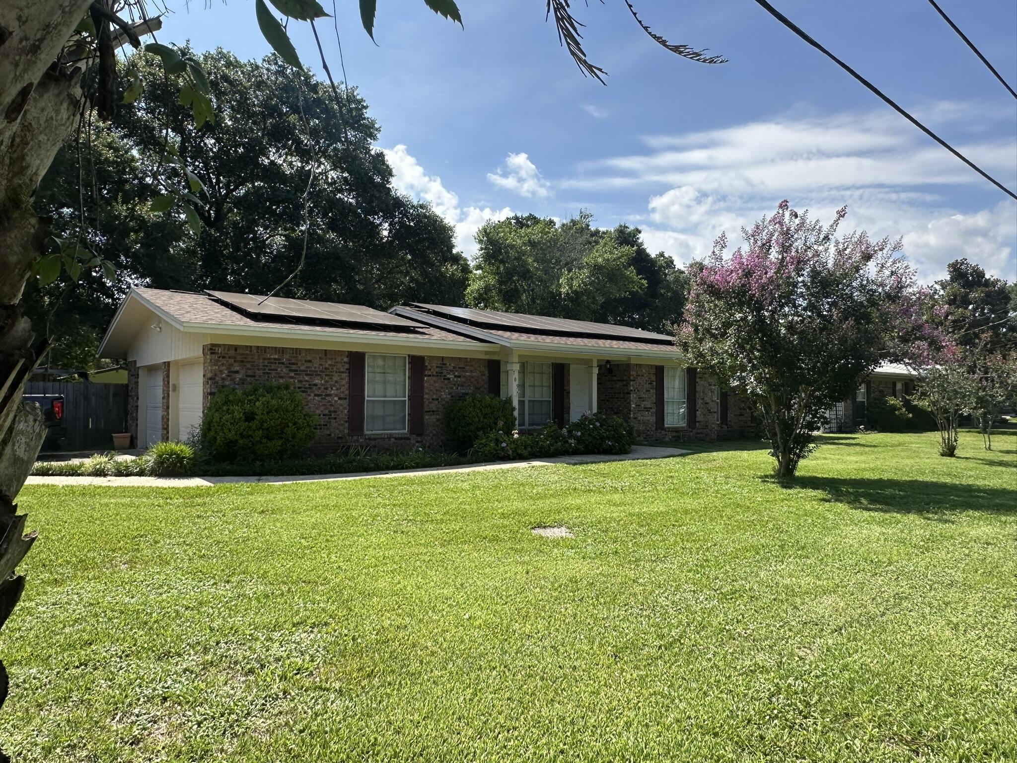 Located in Fort Walton Beach's established Kenwood neighborhood, this four-bedroom, two-bath home offers a combination of recent improvements, valuable upgrades, and a location convenient to everything the Emerald Coast has to offer. A brand-new roof installed in June 2025 provides added peace of mind, while the solar panel system, standby generator, and two-car garage add everyday value. Inside, you'll find a functional floor plan with luxury vinyl plank flooring throughout the main living areas, stainless steel kitchen appliances, and a custom tile shower in the primary bathroom. The fenced backyard offers space to relax, entertain, or enjoy outdoor activities, complete with an 8' x 10' workshop/storage shed and a playground that conveys with the property. Located just minutes from shopping, dining, parks, and the beautiful white-sand beaches that make Fort Walton Beach such a sought-after destination, this home combines practical features, recent improvements, and comfortable living in one complete package.

Seller to pay off Solar and generator loans with an acceptable offer. Power bill has been about $35.98 per month, with November and December normally  Free!