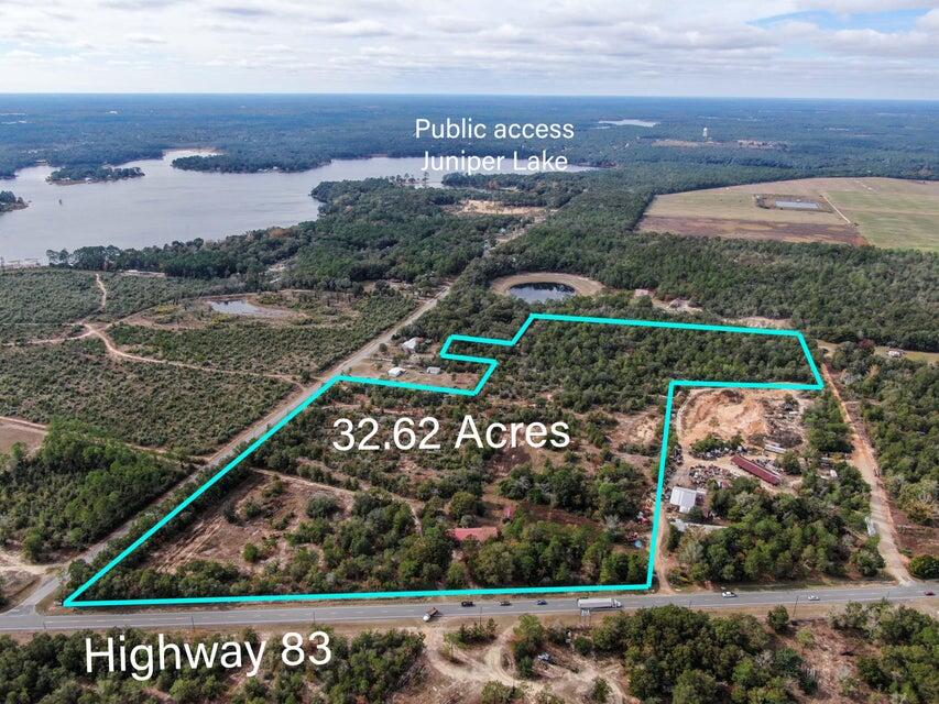 RESIDENTIAL AND COMMERCIAL INCOME GENERATING OPPORTUNITIES!!!  Prime 33-acre mostly cleared parcel zoned Heavy Industrial with utilities in place, offering exceptional flexibility for development. Zoning also allows for general commercial uses, including schools or public facilities, commercial outdoor amusements,  renewable energy projects, offices, warehousing, factory assembly, and storage.  Over 1,000 feet of highway frontage allows major exposure on an arterial highway w/ 3 sided access!  Residential potential includes a mobile home park (up to 12 units/acre) or apartments (up to 17 units/acre). Ideal for investors, developers, or end-users seeking a versatile site with strong growth potential and multiple income-producing possibilities.  Click 'More' for a full description of zoning. 2.02.15. - General Commercial (GC).
The General Commercial District is intended to provide for general commercial uses that serve the larger community and the traveling public. This category permits a broad range of commercial operations and services.

A.Location criteria:1.North, North Central, South Central Walton, and South Walton -- The GC Zoning District shall be located on parcels or lots fronting arterials and major collectors or at intersections of major/minor collectors and arterials unless part of an overall master plan of development. For new GC zoning districts, the proposed location, uses, and development must be compatible with the character and size of the site and the surrounding areas.B.Primary Uses Allowed:1.Lodging and accommodations;2.Civic uses;3.Public uses;4.General commercial uses;5.Neighborhood commercial uses;6.Professional service/office uses;7.Artisanal uses;8.Live/work uses;9.Workplace uses;10.Mobile home parks that are licensed by the Florida Department of Health and Rehabilitative Services are considered commercial developments and are to be reviewed as such. A maximum of 12 mobile home units per acre are allowed within any mobile home park;11.Vertical mixed use: Up to 17 multi-family residential dwelling units per one acre are permitted provided that such units are a located above a ground floor commercial use. Residential uses are subject to the requirements of Section D below;12.Communication towers subject to the limitations and approval process provided in Subsection 5.07.10 and 5.00.04 of this Code.C.Accessory Uses and Structures Allowed:1.Accessory structures and uses in connection with any lawfully existing primary use.D.Conditional Uses Allowed:1.Multi-family residential: In order to facilitate the development of workforce and affordable long-term rental housing multi-family apartment complexes may be authorized within a GC district, subject to the following restrictions:a.Multi-family residential uses are a high density conditional use that require, at a minimum, a showing of need, compatibility with adjacent land uses, and the necessary supporting infrastructure;b.Multifamily residential uses may be developed at a density of up to 17 dwelling units per acre.c.At least 20 percent of the dwelling units shall be dedicated for extremely low income, very low income, low income, workforce, and/or moderate income housing2.Commercial outdoor amusements subject to the following:a.Such uses are not permitted on any parcel located within any designated Scenic Corridor overlay district as described in chapter 6 of this Code.b.Such uses must provide for enhanced landscaping and buffering beyond what is required elsewhere in this Code.E.Reserved.F.Nonresidential Intensity Allowed:1.A maximum FAR of 1.00 (100%) and a maximum ISR of 0.85 (85%).G.Special Development Standards:1.General Commercial developments must be served by central water and sewer facilities;2.All development within this zoning district shall provide for safe and efficient access and shall be required to meet State and County access management design standards for appropriate driveway spacing, interconnections with adjacent parcels, and shared access to collector and arterial roads.3.Standards and regulations for compatibility, landscaping, vehicular and pedestrian access, traffic circulation, signage, and building and parking lot orientation contained elsewhere in this Code may be applicable to developments within this district.
(Ord. No. 2018-29, § II(Att. A), 12-11-18; Ord. No. 2019-19, § II(Att. A), 9-10-19; Ord. No. 2021-33, § II, 11-9-21)

2.02.28. - Heavy Industrial (HI).
This district includes areas devoted exclusively to industrial development, allowing a mix of heavy and light industry, storage, distribution, and other industrial uses.

A.Location Criteria: This zoning district is applicable to the North, North Central and South Central Walton Planning Areas.B.Primary Uses Allowed:1.Heavy Industrial uses;2.Light Industrial uses;3.Extractive uses;4.Communication towers subject to the limitations and approval process provided in Subsection 5.07.10 and 5.00.04 of this Code;5.Public uses;6.Renewable energy uses.C.Accessory Uses Allowed:1.Accessory structures and uses in connection with any lawfully existing primary use.D.Conditional Uses Allowed: Reserved.E.Residential Density Allowed:1.This district does not provide for residential uses.F.Nonresidential Intensity Allowed:1.The maximum intensity for non-residential uses in this district is a floor to area ratio of 0.70 and an impervious surface ratio of 0.85.G.Special Development Standards:1.Twenty-five (25) feet buffer between Industrial uses and any other land use.
(Ord. No. 2018-29, § II(Att. A), 12-11-18; Ord. No. 2019-19, § II(Att. A), 9-10-19)

This district provides for areas containing a single use or combination of uses, such as offices, showroom/warehouse, and light assembly or storage uses that do not generate noise, particulate matter, vibrations, odors, fumes, glare, and other hazards incompatible with residential uses.

A.Location Criteria: This zoning district is applicable to all Planning Areas.
Light industrial districts shall be located on a major collector or arterial roadways with immediate access to the regional roadway network.

B.Primary Uses Allowed:1.Light industrial uses;2.General commercial uses;3.Pubic uses;4.Communication towers subject to the limitations and approval process provided in Subsection 5.07.10 and 5.00.04 of this Code;5.Professional services/office uses;6.Artisanal uses;7.Workplace uses;8.Renewable energy uses.C.Accessory Uses and Structures Allowed:1.Accessory uses allowed within a development include: personal services, business services, restaurants and cafes, newsstands, and similar support uses.D.Conditional Uses Allowed:1.Personal services, business services, restaurants and cafes, newsstands, other similar supporting uses on the condition that they are housed in a building which principally serves allowed primary uses.E.Residential Density Allowed:1.No maximum or minimum residential density is associated with this category, but, a maximum of one (1) dwelling unit may be approved for security purposes for a development.F.Nonresidential Intensity Allowed:1.A maximum FAR of 0.5 (50%) and a maximum ISR of 0.75 (75%).G.Special Development Standards:1.Twenty-five (25) feet buffer between Industrial uses and any other land use.
(Ord. No. 2018-29, § II(Att. A), 12-11-18; Ord. No. 2019-19, § II(Att. A), 9-10-19)