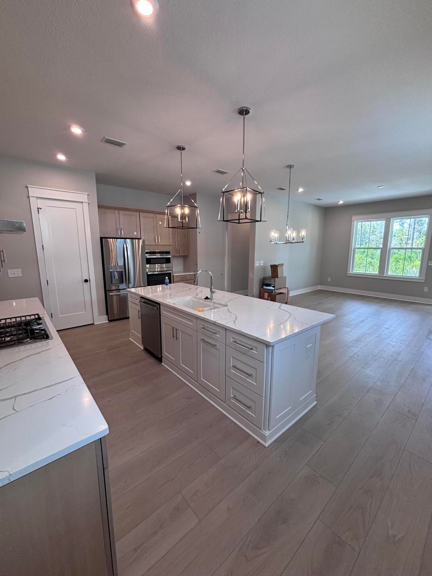 Move-In Ready!! Photos coming soon! 
Welcome to the Lucas by Fischer Homes, a paired patio villa offering 1,410 square feet of single-level living in the Longleaf Park neighborhood of Watersound Origins, perfectly positioned on a homesite with a wooded view. 

This 2-bedroom, 2-bath home features a well-designed layout that flows from the foyer into the open kitchen, dining, and family room, extending to a covered rear patio that takes full advantage of the natural setting. The oversized kitchen island anchors the space, complemented by level 2 quartz countertops, full overlay painted cabinetry with a contrasting island, pot and pan drawers, sliding trays, and a complete upgraded GE Profile appliance package with built-in appliances including a 5-burner gas cooktop, wall oven, microwave, canopy hood, and refrigerator, ideal for both everyday living and entertaining. The owner's suite is privately located at the rear of the home and includes a spacious walk-in closet and a deluxe bath featuring a tiled shower with built-in bench. A secondary bedroom and full bath at the front of the home provide comfortable accommodations for guests or a home office.

Additional features include upgraded level 2 plank flooring throughout, 10-foot ceilings, 8-foot interior doors, craftsman-style trim with 5 ¾" baseboards, a tankless water heater, and an oversized one-car garage with attic storage and pull-down stairs. The covered patio offers a quiet outdoor retreat with wooded views.

Constructed with a structurally independent design, each villa is separated by a 2-hour fire-rated wall assembly for enhanced privacy and peace of mind.

Enjoy low-maintenance living with access to Watersound Origins amenities, including the Origins Golf Course, resort-style pool, sports courts, and more.