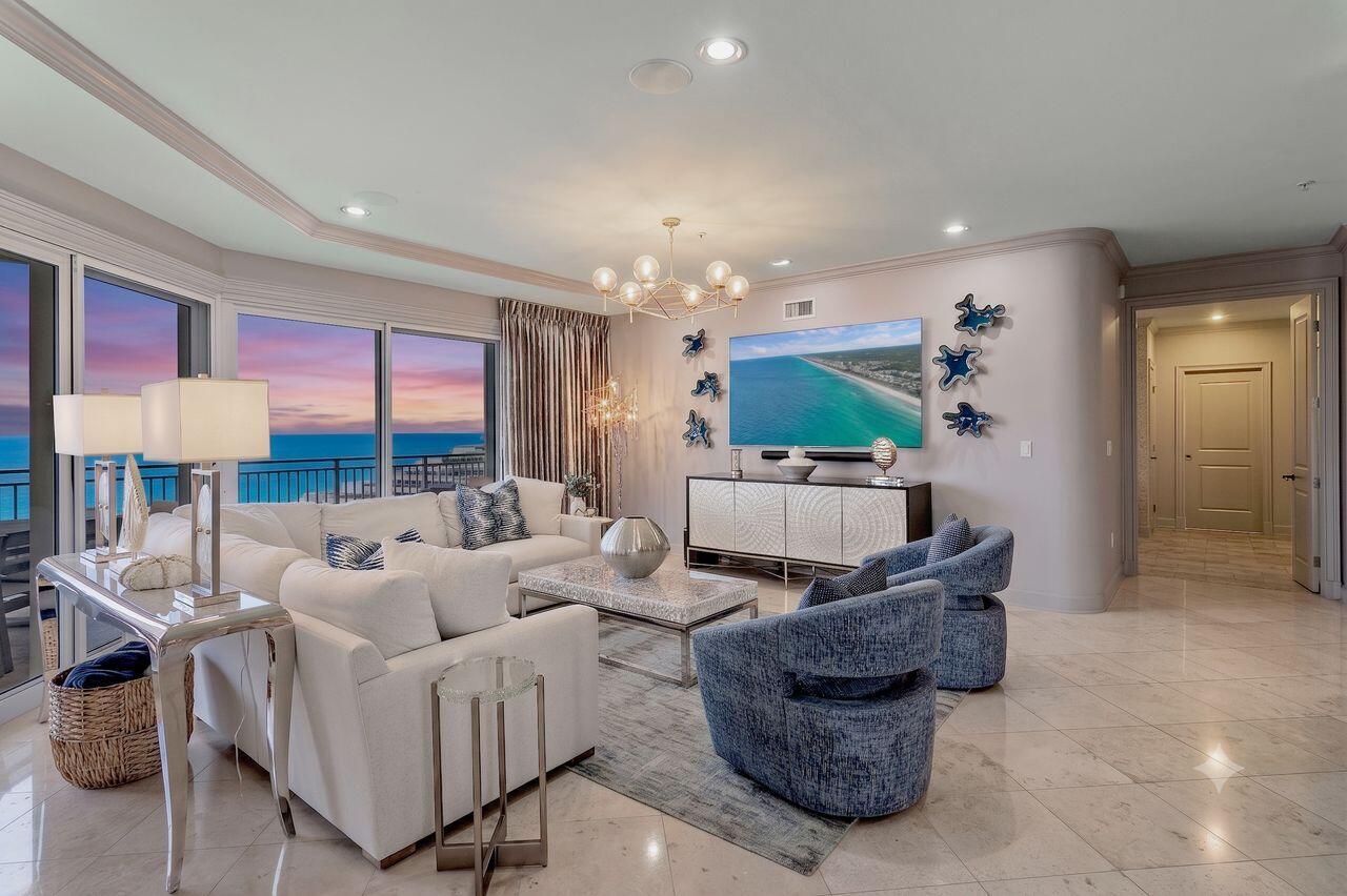 Discover an exceptional Gulf-front retreat in this stunning 10th-floor east-end villa at Grand Dunes II, where sweeping views of South Walton's emerald waters and sugar-white beaches await you! Designed with contemporary-chic interiors by a renowned local designer, this 4-bedroom, 4-bath residence offers 3,030 square feet of beautifully appointed living space and is among the largest villas in the complex. From the moment you arrive through the private foyer, the home reflects thoughtful design, elevated finishes, and an uncompromising attention to detail.
The open-concept gourmet kitchen is designed for both effortless entertainment and refined daily living. It features top-of-the-line stainless steel appliances, a five-burner natural gas cooktop, double ovens, an icemaker, custom granite countertops, and custom cabinetry enhanced with upgraded hardware. Throughout the villa, 9.5-foot ceilings, curated artwork, wallpaper accents, designer lighting, and custom draperies create a sophisticated coastal atmosphere. The living area includes an 85-inch HD TV with Sonos surround sound, while each bedroom is thoughtfully finished with custom bedding, draperies, and flooring.  Additional features include travertine floors in the foyer, living area, dining room, kitchen, and baths; custom area rugs; and a central vacuum system for added convenience. The Primary Suite offers a serene Gulf-front escape with an 8-foot interior door, expansive water views, a comfortable seating area, his-and-her walk-in closets, custom flooring, and elegant furnishings and accessories. The fully renovated primary bath is equally impressive, featuring a soaking tub beneath a designer chandelier with an arctic ledger tile surround, a separate dual-head shower, custom soft-close vanities, VitrA porcelain sinks, custom flooring, and a private water closet.
Outdoors, the oversized Gulf-front balcony expands the living space with more than 350 square feet for relaxing, dining, or entertaining. Beautiful furnishings, a built-in natural gas grill, and hurricane shutters make this spacious balcony both inviting and practical.
Grand Dunes provides an outstanding collection of resort-style amenities, including gated entry with 24-hour security, lush landscaping, three levels of gated underground owner parking, a grand lobby, semi-private elevators to your private foyer, a private heated pool and hot tub, an owner's lounge with a Gulf-front fitness room, overflow suites for guests, 200 feet of deeded beach, a majestic waterfall, and a lagoon-style Gulf-front pool area with a hot tub shared by both buildings, plus beach service. 
This tranquil Gulf-front oasis, offered turnkey with only a few personal items excluded, delivers a rare combination of privacy, design, and resort-style living in one of South Walton's premier beachfront communities.