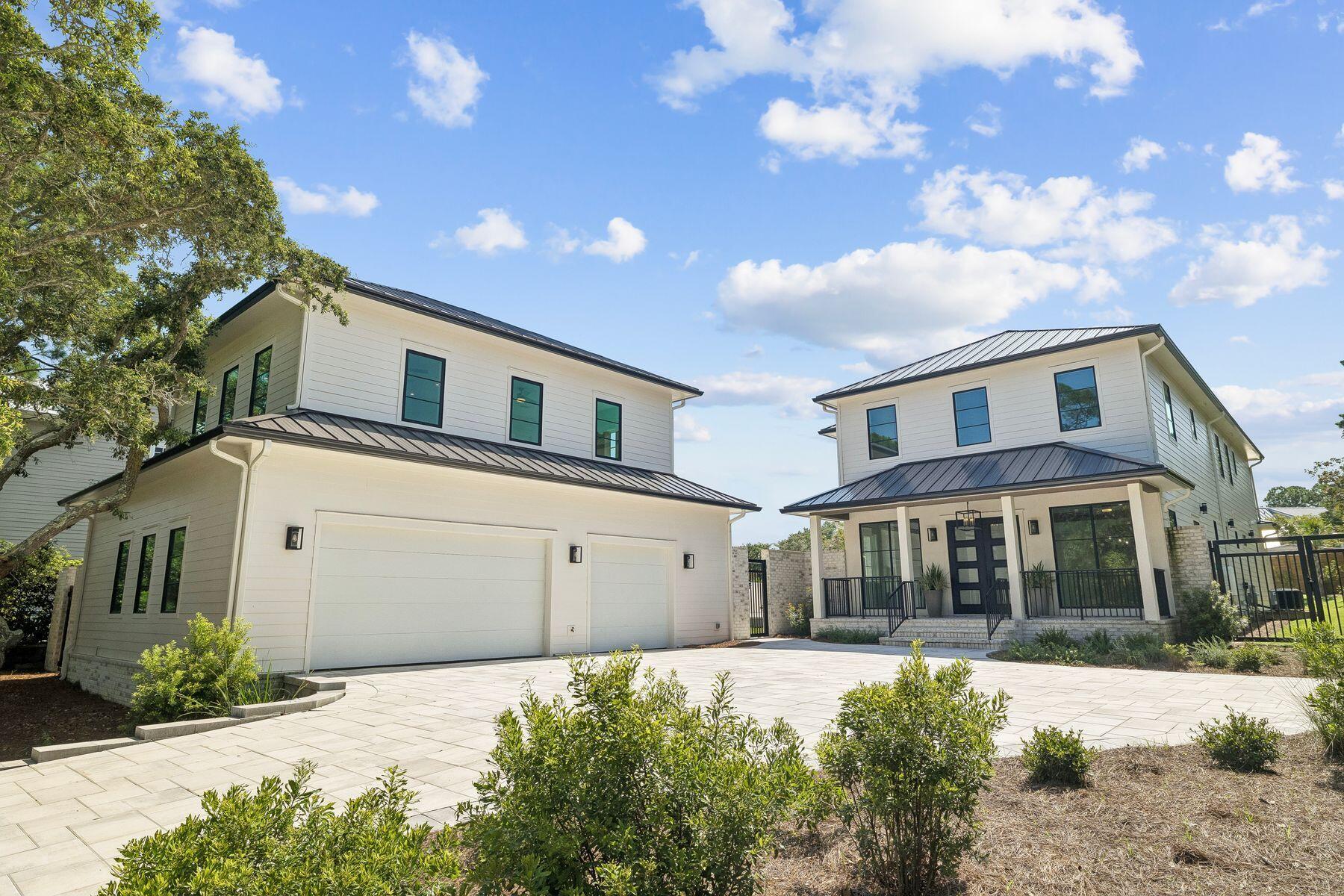 Set among mature, moss-draped oaks in the low-density enclave of Gulf Pines, this 2025 new-construction compound pairs the polish of fresh build with the rooted, settled feeling those trees only give a property over time. Five bedrooms in the main house, a freestanding studio carriage house over a three-car garage, a saltwater pool, and a sprawling lawn-and-turf yard sit behind the privacy walls of a gated compound, with a large motor court for eight vehicles. Private deeded beach access is moments away.
Inside, casement windows and a wall of Florida glass wash the main living room in light, anchored by a stacked-stone fireplace with a Heat & Glo insert and pre-wired for a mounted television. Wood beams draw you toward a fully custom kitchen: stained maple cabinetry, a six-burner-plus-griddle JennAir gas range with dual ovens, a 48-inch Sub-Zero French-door refrigerator, Bosch dishwasher, commercial-grade vent hood, and a Calacatta marble island. The dining room opens through a four-panel Euro wall directly to the covered al fresco porch and pool deck, with space for a banquet table that seats the whole family. Tucked beneath the steel-and-maple view-rail staircase, a wet bar with leathered-stone counters, beverage fridge, and a private pool door makes hosting effortless. The main-level primary suite is its own retreat, opening through a three-panel Euro wall, with a hammered-finish chandelier, dual vanities, and an oversized shower clad in 42-inch marble tile set vertically beneath a frosted transom. The 12-by-12 walk-in closet has it all: multi-height hanging, angled shoe shelving, built-in drawers, and overhead storage for luggage and seasonal pieces.
Upstairs, a light-filled landing doubles as a game room or lounge, and a second primary suite anchors the floor with his-and-hers closets, a dual vanity, and a vertically laid marble shower. Two additional guest rooms share a Jack-and-Jill bath with Brizo fixtures, subway tile, and a private water closet; an elevated roofline gives one guest room eleven-foot ceilings. An additional guest room is ideal for an office or bunk room with a Romeo and Juliet balcony. A second laundry room serves the upper level.
Above the garage, the private studio carriage house has its own entrance, a fully tiled walk-in shower, an oversized vanity with a makeup area, a kitchenette, and flex space for guests, extended family, a caretaker, or rental income.
Outside, the oversized saltwater pool features a three-step entry, a tanning shelf, bench seating, and a sunning deck. A separate turf zone is ready for cornhole, ping-pong, volleyball, or a playground, with an outdoor shower close by.
Situated within the established Gulf front community of Gulf Pines, this organically planned neighborhood offers architectural significance blended with classic old Florida charm and an amazing community beach with deeded access.