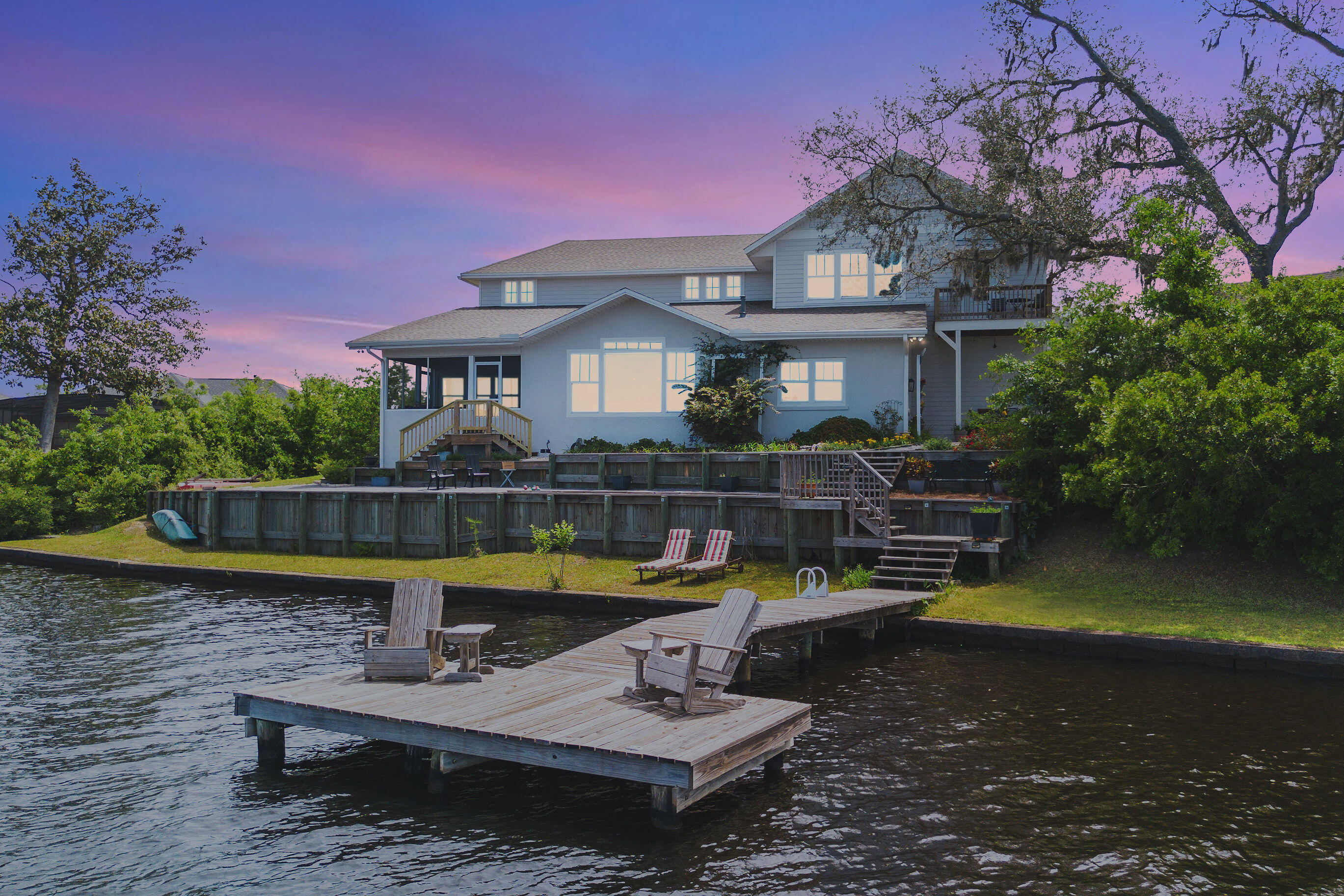 Experience true enchantment at 7831 Highway 2311 on Deer Point Lake. This iconic 5BR/4.5BA estate offers a rare ''floating'' experience, sitting less than 25 feet from the water--a grandfathered proximity impossible to replicate today. Originally a 1950s cottage, this 3,400+ SF masterpiece blends historic charm with Architectural Digest luxury. Discover an open-concept interior with soaring ceilings, luxury appliances, and reclaimed heart pine/Amish oak floors. The 1-acre grounds feature a ''Secret Garden,'' 152ft of sunset-facing waterfront, a private dock, and a lakeside fire pit. With two master suites and panoramic views, this home marries old-world soul with modern innovation. A must-see waterfront sanctuary that defines luxury lakeside living.