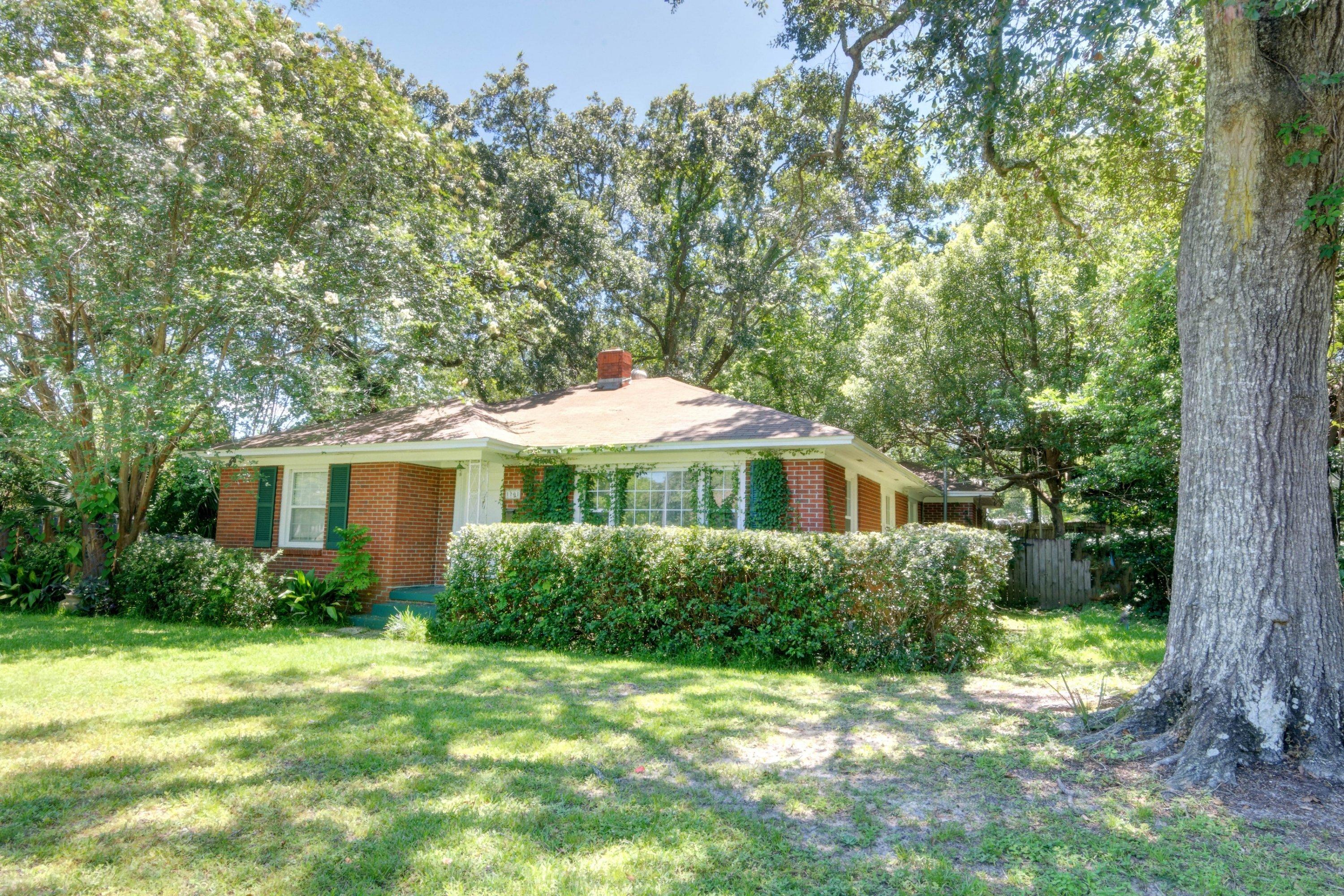 East Hill Retreat! This 2br/2ba with Florida Room, brick home in Pensacola's most vibrant and up-and-coming neighborhood is a shady retreat under mature Crepe Myrtle and towering Live Oak trees. Perched on the corner lot, and walking distance to City Grocery and J's Bakery, this home is also close to downtown, shopping, dining and the sugar sands of Pensacola Beach, but still breathes peace and tranquility inside. Hardwood floors, being updated this month (August), built in book cases, large beautiful bedrooms and a huge florida room.