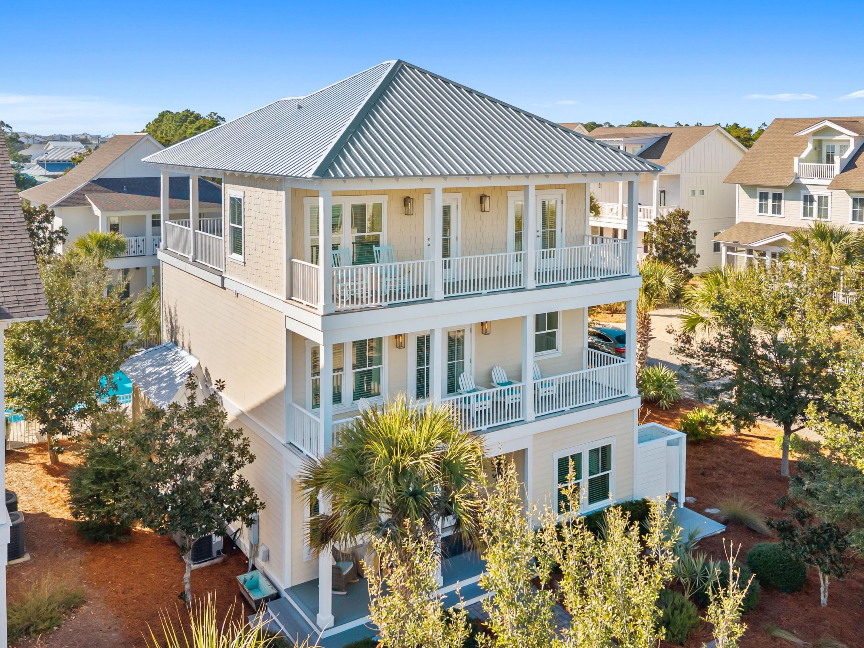 Positioned in the heart of Seagrove Beach within the charming community of Magnolia Dune, 77 Sandalwood Drive offers the quintessential 30A lifestyle -- where beach days, celebrated dining, and relaxed coastal living are all just moments from your front door. This three-story retreat enjoys exceptional proximity to public beach access while placing owners and guests within easy walking distance of beloved local favorites, including Café Thirty-A, The Perfect Pig, Angelina's, and nearby Seaside, Florida. Designed with both comfort and entertaining in mind, the residence showcases an open-concept floor plan accented by rich hardwood flooring, quartz countertops, stainless steel appliances, and beautifully tiled baths. The spacious main living area flows seamlessly into the kitchen and outdoor entertaining spaces, where a built-in gas grill creates the perfect setting for gathering after a day on the beach. A highly desirable first-floor guest suite offers convenience and privacy for owners and visitors alike.

Thoughtfully configured across three levels, the home comfortably accommodates multiple families while maintaining strong appeal as a vacation-rental investment, with a proven track record of exceptional rental performance. Whether enjoyed as a primary residence, second home, or income-producing coastal retreat, 77 Sandalwood Drive captures the effortless elegance and enduring demand that define life along Scenic Highway 30A.
