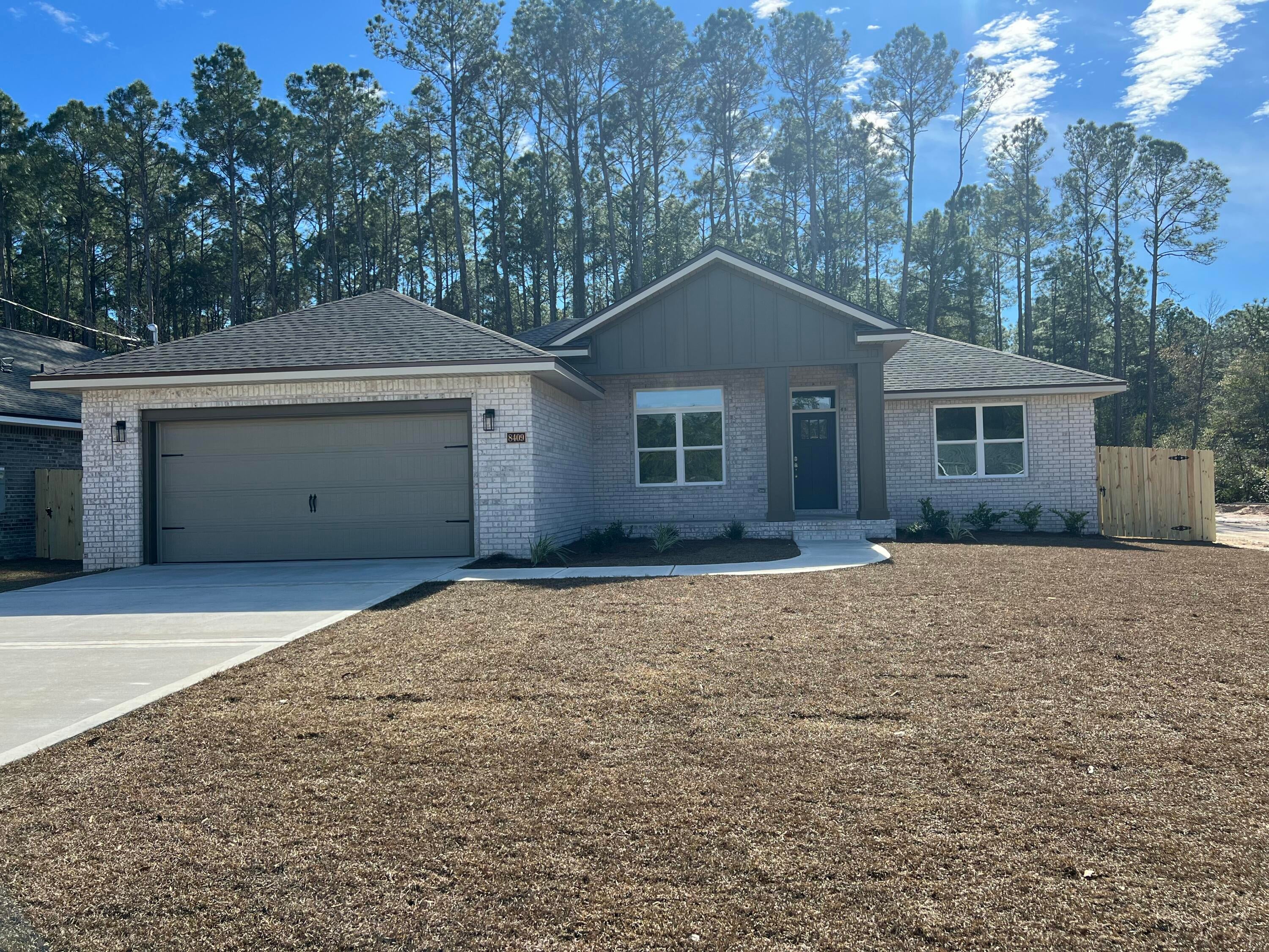 Tucked amongst a natural buffer of trees your New Craftsman Built home awaits .Nestled at the end of 4 other new builds~This luxurious 3 bed/2 bath floor plan with a 2 Car garage will be ready for an late fall move in ~Great Central Location with easy access to~Navarre Beach,Navarre Waterfront Park and Hwy 98 to Hurlburt Field AFB.This Stunning Robbins Builders Custom Home offers trend setting Features~Greeted by a walk in foyer sweeping through to your open floor plan~Large kitchen enjoying Shaker cabinets with crown molding, beautiful quartz counter tops~Under mount sink~S/S appliances ~Two pantries ~ Center Island with sleek top breakfast bar & open flow to the dining area, large family room & separate office/flex room all enhanced with gorgeous vinyl plank flooring.Master bedroom with trey ceiling & ceiling fan~ Master bathroom boasts plenty of dressing area with his and her closets ~ oversized TILED walk in shower with seamless glass door~quartz vanities with rectangular under mount sinks ~picture frame mirrors and separated by a large linen closet all beautifully complimented by brushed nickel fittings. Additional bedrooms are a great size, double closets and ceiling fans~Additional bathroom has a large vanity with a tub/shower and adjacent linen closet. Home has a welcoming covered front porch and large covered back porch to sit out and enjoy those wonderful Florida evening ~great to cook out and entertain with a South facing back yard surrounded by trees.Irrigation .. well and timed sprinkler system for easy care~ Hurricane protection for windows and dimensional shingle roof for lower insurance premium. Upgrades throughout include crown molding, recessed lighting , deluxe lighting package,50 Gallon water heater, garage door remotes, attic drop down stairs~ to name a few....Call today for further information