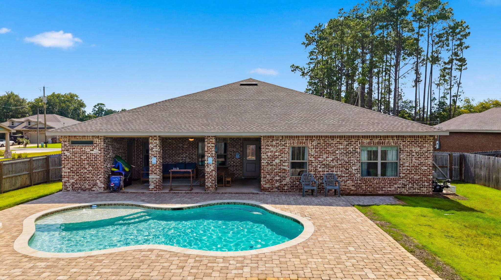 Built in 2023 and offered fully furnished, this five-bedroom, three-bathroom Navarre home pairs nearly new construction with a standout outdoor living space that is ready to enjoy from day one.

Step outside to a custom gunite pool, covered patio, and fully fenced backyard designed for entertaining, relaxing, and spending time with family. With open farmland directly behind the property, the backyard feels more private and peaceful than you might expect, creating a setting that is hard to replicate.

Inside, more than 2,600 square feet provides plenty of room to spread out. The open-concept living area features luxury vinyl plank flooring, granite countertops, shaker-style cabinetry, stainless steel appliances, crown molding, tray ceilings, and abundant natural light. Five well-sized bedrooms offer flexibility for family, guests, a home office, or additional living space.

Located in a quiet, non-HOA community, 2590 Lovewood Drive offers a combination that is becoming increasingly difficult to find in Navarre: a newer home, generous square footage, a private pool, no HOA, and furnishings already in place. Whether you are looking for a primary residence or simply want a move-in ready home with room to enjoy both indoors and out, this property is ready for its next chapter.