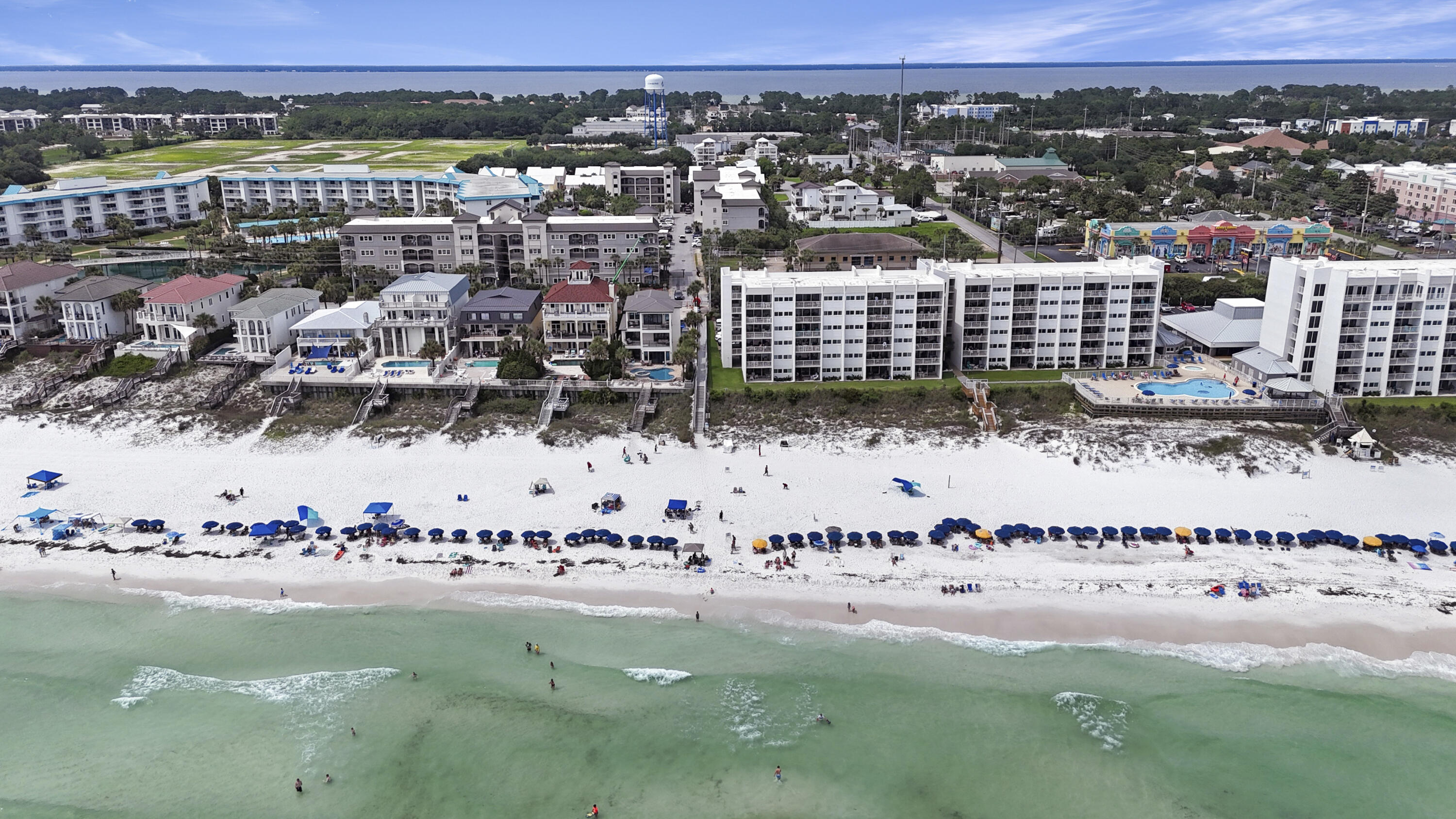 Located in the coveted ''A Building'' at Alerio, one of Miramar Beach's newest and most desirable condominium communities, this rare ground-floor unit offers exceptional convenience and easy Gulf access. Situated just steps from the sugar-white sands and emerald waters of the Gulf of Mexico, this prime location provides the feel of beachside living without the beachfront price. Enjoy the ease of no elevators or stairs and convenient proximity to the community pool.
Alerio A101 features 3 bedrooms, 2 full bathrooms, and is highlighted by 10-foot ceilings, granite countertops, stainless steel appliances, wood flooring throughout, luxury finishes, and designer fixtures. The open-concept living area is spacious and inviting, offering ample room for relaxing and entertaining.
The kitchen is thoughtfully designed with generous preparation and serving space, granite countertops, a breakfast bar, and stainless steel appliances. The oversized bedrooms provide comfortable accommodations for owners and guests alike. The primary suite includes a beautifully finished bathroom with tile finishes and a fully tiled walk-in shower extending to the ceiling.
This meticulously maintained condo features all hard-surface flooring, neutral colors, and a coastal-inspired design. Recent improvements include a brand-new HVAC system, and two bedroom TVs have been upgraded to Smart TVs for added convenience and enjoyment.
Being sold fully furnished, this property is turnkey and rental ready, offering excellent income potential. Conveniently located in the heart of Miramar Beach, residents and guests enjoy quick access to shopping, dining, and entertainment, making this an ideal investment property, second home, or full-time residence.