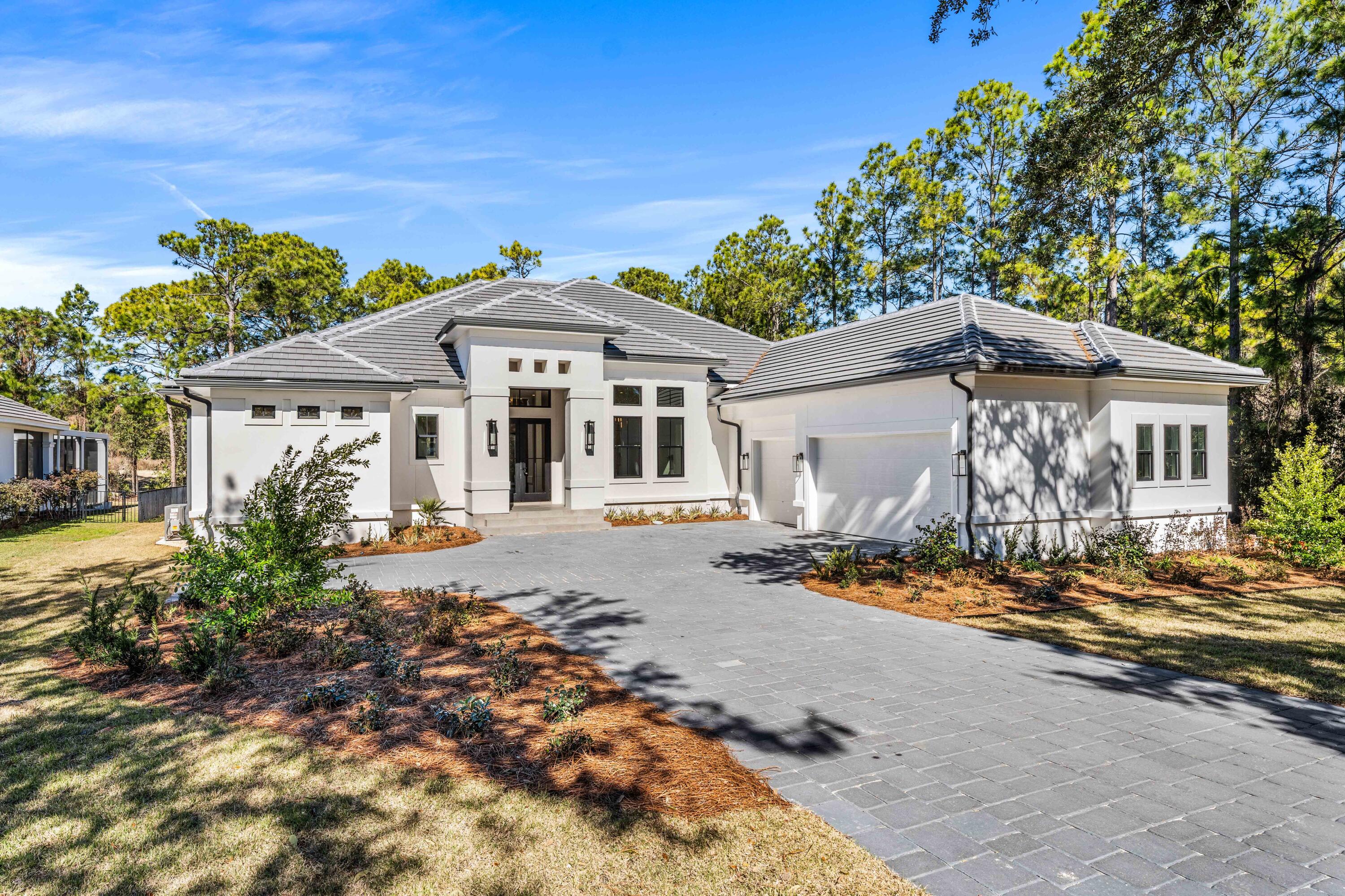 Some homes impress the moment you arrive. Others continue to reveal themselves with every room. This exceptional new construction residence in the gated community of Regatta Bay Golf & Yacht Club does both.

Perfectly positioned on nearly one-half acre overlooking the first hole of Regatta Bay's championship golf course, this thoughtfully designed single-level home blends sophisticated design with effortless everyday living. A soaring 16-foot foyer creates an unforgettable first impression, leading through the heart of the home to nearly 1,000 square feet of covered outdoor living, where mornings begin with peaceful golf course views and evenings are made for entertaining.

The chef's kitchen features a premium Thermador appliance package and opens seamlessly to the spacious living and dining areas. The privately situated owner's suite occupies its own wing, while three additional bedrooms provide comfortable accommodations for family and guests. Additional features include a three-car garage with decorative epoxy flooring, an expansive walk-in attic for exceptional storage, a four-zone Sonos audio system, and golf cart access to the clubhouse, golf course, Legendary Marine, Destin Commons, shopping, and dining. A rare opportunity to own a brand-new luxury home in one of Destin's premier gated golf communities. The chef's kitchen is equipped with premium Thermador appliances and opens naturally into the main living areas, creating an ideal setting for hosting or quiet evenings at home. Privately situated, the primary suite spans the entire left wing of the residence -- a true retreat offering space, privacy, and tranquility.
Additional highlights include a spacious three-car garage with decorative epoxy chip flooring, an expansive walk-in attic for exceptional storage, 4 zone Sonos sound system, and convenient golf cart access to the Regatta Bay clubhouse, Legendary Marine, Destin Commons, and more.
A rare opportunity to own a one-level new construction home in one of Destin's most sought-after gated golf communities.
