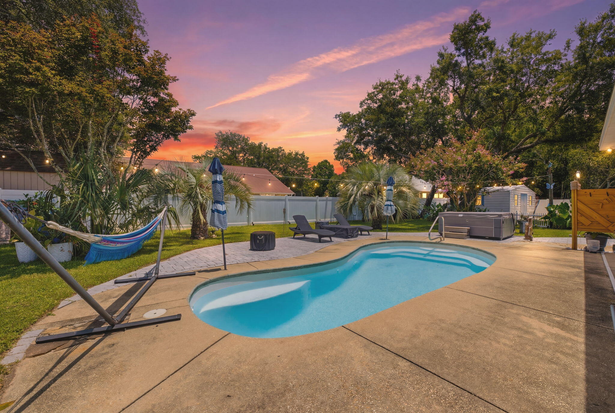 Welcome to one of Navarre's most sought-after neighborhoods--Tom King Estates. Known for its winding streets, towering oak trees, shaded sidewalks, and welcoming atmosphere, this is the community everyone talks about. Whether you enjoy morning walks with the dogs, evening bike rides, or simply being surrounded by nature, you'll quickly understand why homes here are so highly desired.

Nestled on a quiet cul-de-sac, this beautifully redesigned pool home has been thoughtfully updated inside and out while offering a floor plan that is rarely found. One of its standout features is a true private mother-in-law suite complete with its own kitchen, living room, bedroom, and direct access to the backyard and pool. Whether you're accommodating multigenerational living, caring for a loved one, hosting long-term guests, or creating a private roommate arrangement, this flexible space offers endless possibilities.

The main living area features a desirable split-bedroom design, providing privacy for everyone in the home. Recent improvements throughout include updated flooring, lighting, hardware, and numerous modern finishes that create a fresh, move-in-ready feel. Step outside and discover your own private retreat. The beautifully landscaped backyard showcases a fiberglass swimming pool, outdoor shower, lush irrigation, mature landscaping, fruit trees, and plenty of room to relax or entertain. Need space for your hobbies and toys? You'll appreciate the oversized workshop along with generous parking for multiple boats, RVs, trailers, or additional vehicles.

Additional highlights include a 2020 roof, hurricane protection that may help reduce insurance costs, a septic system that was pumped and inspected last year, and a new water heater scheduled for installation before closing. The HVAC system is believed to have been replaced around 2019; buyers are encouraged to verify all information during their inspections.

Best of all, this property is located outside of a flood zone, so flood insurance is not required, and there is no HOA--giving you the freedom to truly enjoy your property.

As an added bonus, homeowners have the opportunity to obtain bay access through the neighboring Robledal community with a one-time membership fee, offering convenient access to one of Navarre's most treasured natural resources.

This home has been professionally cleaned and is truly move-in ready. Please help protect the brand-new flooring by wearing the complimentary shoe covers provided at the front door.

Pool homes in Tom King Estates rarely become available--especially those offering this level of flexibility, privacy, and outdoor living. If you've been waiting for the perfect place to call home, this may be the one you've been searching for.