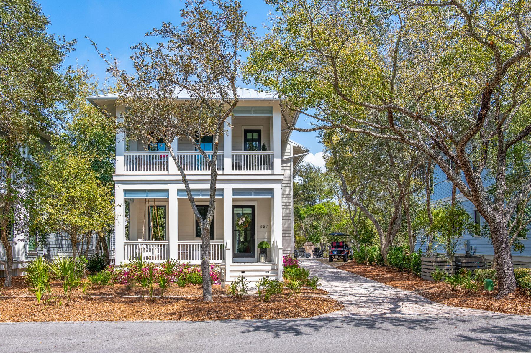 The newest home in Phase 1 of WaterColor, 657 Western Lake Drive offers a rare opportunity to own what essentially lives as a brand-new home in the most established and sought-after section of the community. Completed in January 2025 following a comprehensive top-to-bottom rebuild, every aspect of the home has been thoughtfully redesigned and reconstructed with high-quality materials, modern systems, and refined coastal finishes--creating a residence that feels entirely new in the heart of original WaterColor.

Perfectly positioned overlooking Western Lake and directly along the WaterColor walking trails, the home places you in the center of the community's most iconic amenities. Cerulean Park, the LakeHouse, Boathouse, and Marina Pool are just steps away, while the WaterColor Beach Club, Gulf-front pools, the beach, the WaterColor Inn, and the shops and restaurants along 30A are all conveniently nearby. Tennis and pickleball courts, the future fitness center, Camp WaterColor, and the Frog Pool are also easily accessible, while the boutiques and dining of Seaside are just a short bike ride away along the scenic 30A path, or a quick walk down the "secret path".

The nearly 3,100-square-foot home offers four bedrooms and four-and-a-half bathrooms, along with four covered decks designed to capture views of Western Lake and the surrounding natural landscape. Two screened rear decks connect seamlessly to the living room and primary suite through folding-glass doors, expanding both spaces and creating an exceptional indoor-outdoor living experience.

Inside, the home showcases elevated craftsmanship throughout, including white oak hardwood flooring, custom white oak staircases and ceiling treatments, vaulted ceilings with exposed beams, and detailed nickel-gap shiplap and board-and-batten walls. Gas fireplaces anchor both the living room--finished in Venetian plaster--and the primary suite, which features a beautifully designed vaulted ceiling with white oak beam detailing.

The chef's kitchen is designed for both everyday living and entertaining, featuring custom cabinetry by Grimes Cabinets, a walk-in pantry with built-in white oak wine storage, and a fully panelized Thermador appliance suite including a 36-inch six-burner gas range, double ovens, a 42-inch refrigerator, wine refrigerator, dishwasher, and four refrigerated drawers.

Additional upgrades include all-new electrical, plumbing, and HVAC systems with two Bosch units, spray foam insulation, a tankless water heater, and Marvin Ultimate StormPlus hurricane-rated windows and doors. Exterior improvements include HardiePlank siding, a standing seam metal roof, Ipe decking across the covered porches, a paver driveway, new landscaping and irrigation, a gas fire pit, outdoor grill station, and dedicated golf cart parking with a charging station.

With its rare "like-new" rebuild, exceptional craftsmanship, and premier Phase 1 location near WaterColor's most sought-after amenities, this home offers an extraordinary opportunity to experience the very best of the WaterColor lifestyle.