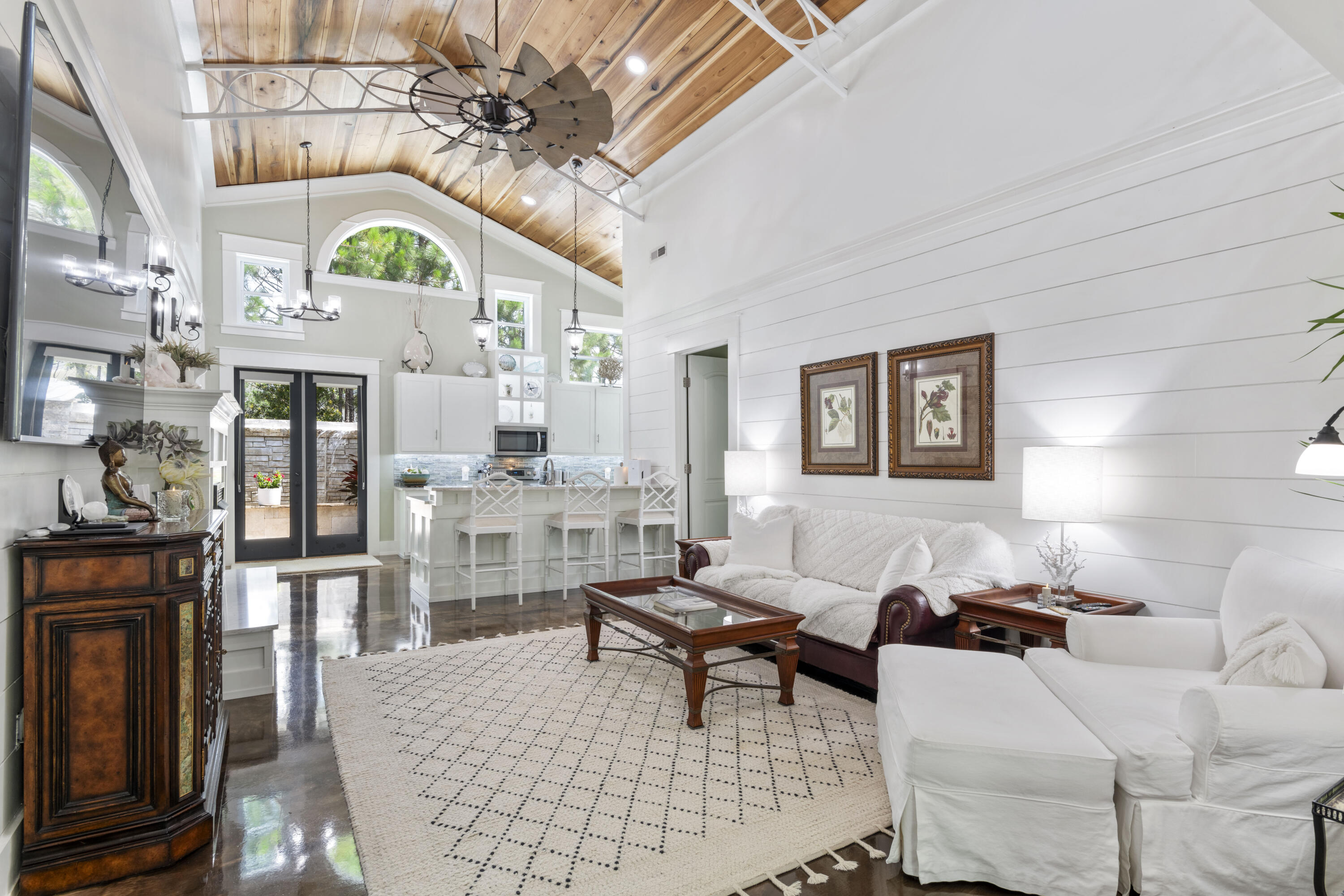 Experience the best of Florida living in this exceptional custom-built home, where distinctive design and craftsmanship are showcased throughout. From the stunning poplar wood ceilings and striking three-dimensional epoxy flooring to the durable metal roof and oversized two-car garage, every detail has been thoughtfully curated.

The interior is appointed with high-end custom finishes, including 8-foot solid wood doors, soaring ceilings, elegant iron staircase accents, and dramatic floor-to-ceiling windows and glass doors that fill the home with natural light. The open-concept kitchen serves as the heart of the home, featuring exquisite quartzite countertops, premium appliances, and beautifully crafted cabinetry.

The spacious owner's suite provides a private retreat, complete with a luxurious spa-inspired bath designed for ultimate comfort and relaxation. A well-appointed secondary bedroom offers an inviting space for guests, while the versatile loft overlooking the main living area is ideal for a home office, media room, or additional sleeping accommodations.

Step outside to an equally impressive outdoor oasis, highlighted by a stunning stone waterfall feature and a covered entertaining area perfect for hosting family and friends year-round.  Ideally located in the highly sought-after Santa Rosa Beach area, this one-of-a-kind property offers convenient access to dining, shopping, entertainment, and the area's renowned white-sand beaches. Don't miss this rare opportunity to own an extraordinary home at an exceptional value!