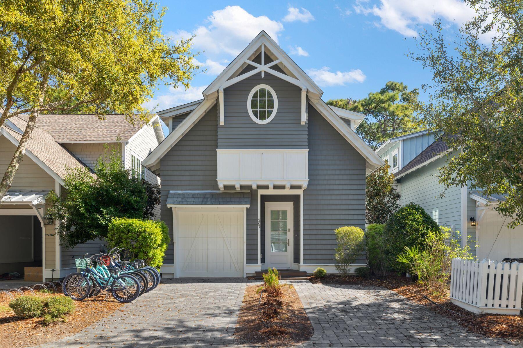 This quintessential beach cottage in WaterSound West Beach boasts three beds, four-and-a-half baths and lots of hidden extras. Fully furnished, it's designed to comfortably accommodate 14 guests. Completed in 2020 to a design by R.W. Lowe Architecture, this attractive coastal retreat was built to the highest standards by Ryan Harp Construction. With two primary suites, a bunk area and a fun-filled game arcade on the second floor, it's ideal as a full-time residence or as a vacation home with rental potential. Leave your vehicles on the twin parking pads and head inside. The open floor plan is designed for seamless indoor/outdoor living, whether you're enjoying a peaceful break or entertaining family and friends. Bathed in natural light, the spacious living area has designated areas for cooking, dining and relaxing. Shiplap walls, airy 10-foot ceilings and gorgeous wood flooring enhance this attractive space, all lit by designer lighting. The pristine white kitchen is very much a part of the social space, with an expansive quartz-topped breakfast bar. Five stools invite social conversation over long, cool drinks and tasty snacks. This well-appointed space has ample storage, KitchenAid professional appliances and a generous six-burner stove beneath an oversized hood. Beyond the sitting area, French doors open onto a sunny screened porch. It's a place for relaxing and enjoying the peaceful, sun-dappled views of the preserved woodland. Imagine breakfast outdoors accompanied by the sound of birdsong as you plan the day's activities. Return in the evening for sunset cocktails after rinsing off sandy feet under the outdoor shower. The cottage includes a first-floor master suite for living all on one level, if required. Four built-in bunks make good use of the flex space on the second-floor landing, and there's still room for a comfy sofa and a wall-mounted TV. The adjoining bathroom with artisan tile adds another practical touch. Tucked around the corner, the gaming arcade is sure to be popular with kids of all ages. The second-floor master suite also makes good use of space with a king-sized bed, a reading area and additional space for a desk. Beneath the sloping eaves, the third bedroom is furnished with two queen beds. Another pristine ensuite bathroom provides private facilities for visiting guests. This serene coastal retreat includes a garage housing a six-seat golf cart for getting around. Feel the breeze in your hair as you explore winding boardwalks lined with mature pines, play golf or visit the beautiful beach, all within this exclusive gated community. Residents and guests can also enjoy the heated resort-style community pool with shady cabanas, outdoor grills and a cozy fire pit for toasting s'mores.