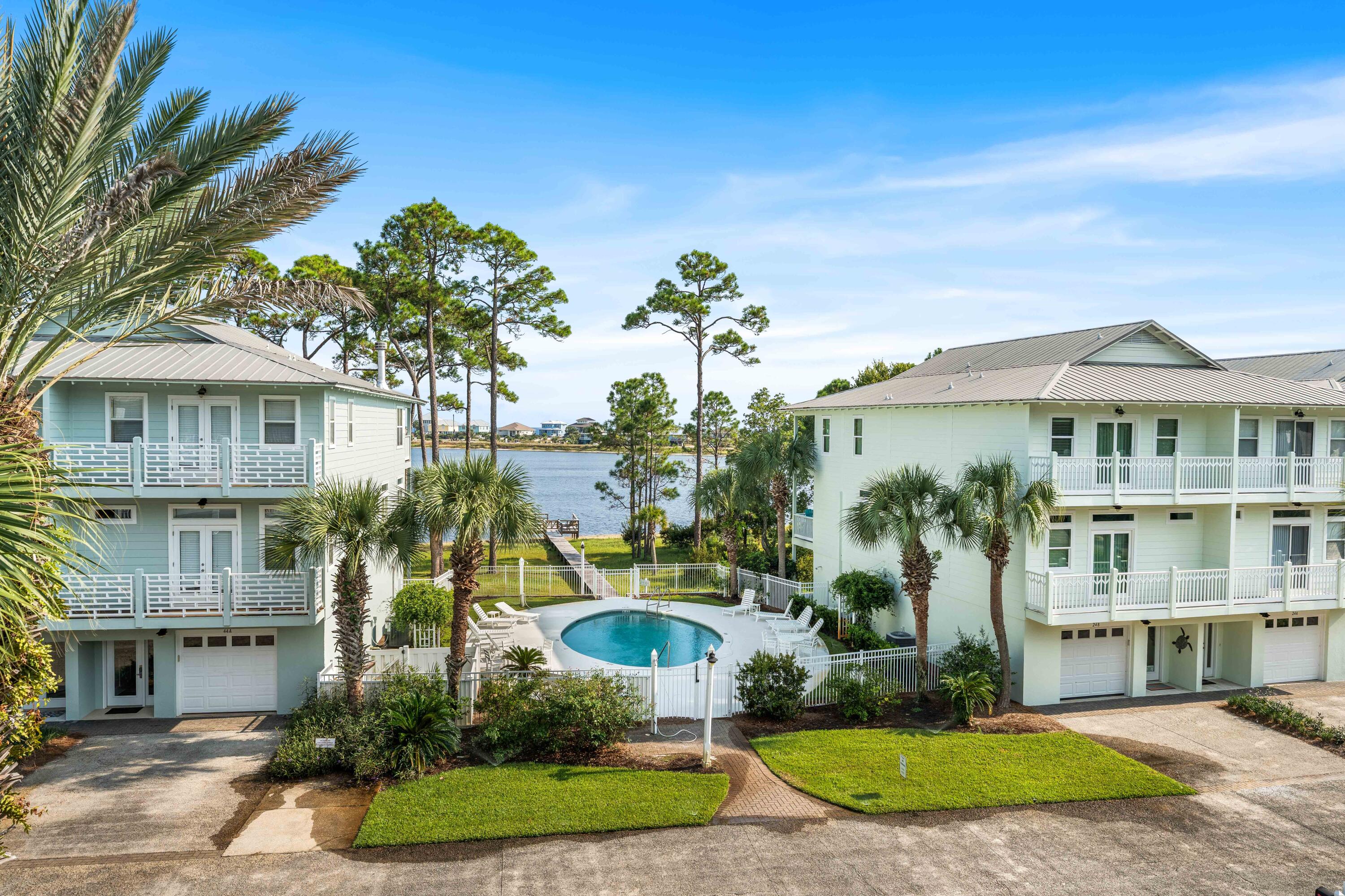 Located in the heart of Santa Rosa Beach, this turnkey townhome offers stunning unobstructed views of the coastal dune lake and community pool with no homes blocking your view. This beautifully designed 4-bedroom, 4-bath townhome features a spacious layout ideal for full-time living, vacationing, or investment potential. Unique to the property are two full kitchens, providing excellent flexibility for large groups, guests, or maximizing rental income. Recent updates include renovated bathrooms, updated kitchens, and refreshed flooring and furniture, adding a modern coastal feel throughout the home. Enjoy open-concept living spaces filled with natural light, multiple outdoor areas to take in the views, and a private garage for added convenience. Located just minutes from the white sand beaches of 30A, dining, shopping, and entertainment, this property combines luxury coastal living with strong short-term rental appeal. A rare opportunity to own a view-focused townhome in one of the Emerald Coast's most desirable locations.