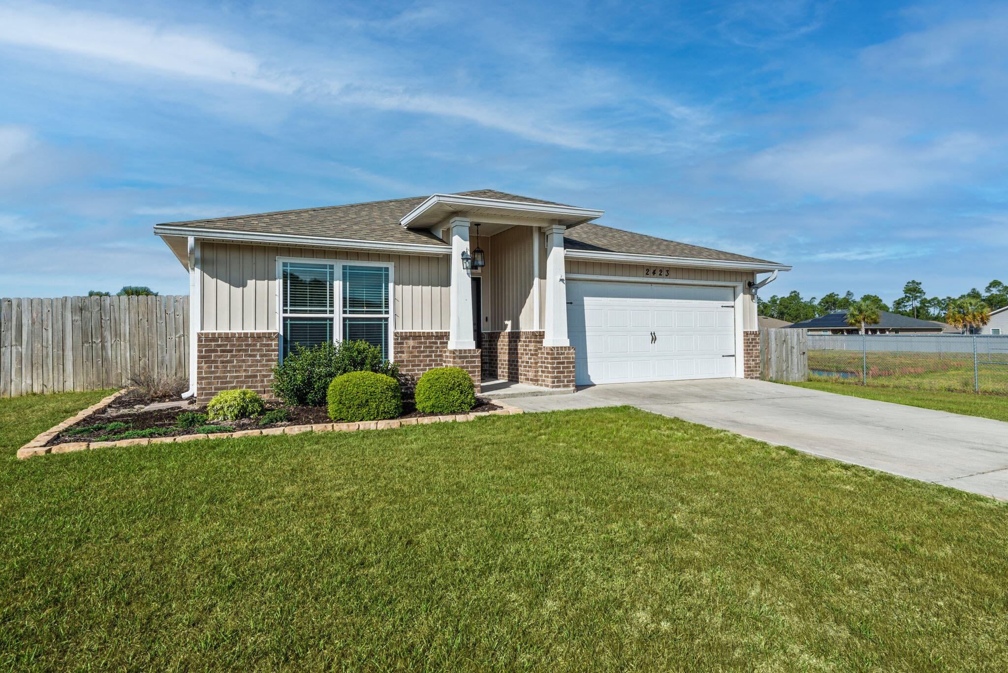 Welcome to 2423 Spur Lane, a move-in ready home in the desirable Heathers Place community of West Navarre, perfectly positioned for buyers seeking comfort, space, and convenience. Built in 2018, this 3-bedroom, 2-bath home offers 1,791 square feet of well-designed living space on a large, fully fenced .30-acre lot, giving you the room and privacy that's increasingly hard to find. Inside, the open-concept layout is ideal for everyday living and entertaining, with high ceilings and durable luxury vinyl plank flooring throughout the main areas. The kitchen is both functional and inviting, featuring granite countertops, stainless steel appliances, a center island, and ample cabinet space. The living and dining areas flow seamlessly, creating a comfortable space for hosting guests. The primary suite offers a quiet retreat with a tray ceiling, double vanity, soaking tub, and separate walk-in shower. Two additional bedrooms provide flexibility for guests or a home office. Step outside to a screened back patio overlooking a spacious, fenced backyard, ideal for outdoor living year-round.

Located just minutes from Hurlburt Field, Navarre Beach, and highly rated local schools, this home offers an easy commute and access to everything that makes the Navarre area so desirable. The neighborhood features sidewalks, adding to the clean, well-maintained feel.

In addition to the home's features it is currently financed with an assumable VA loan at an attractive 2.99% interest rate, offering a rare opportunity for qualified buyers to secure significantly below-market financing. If you're looking for a home that checks the boxes for space, functionality, and location, while still delivering the coastal lifestyle - 2423 Spur Lane is a strong fit.