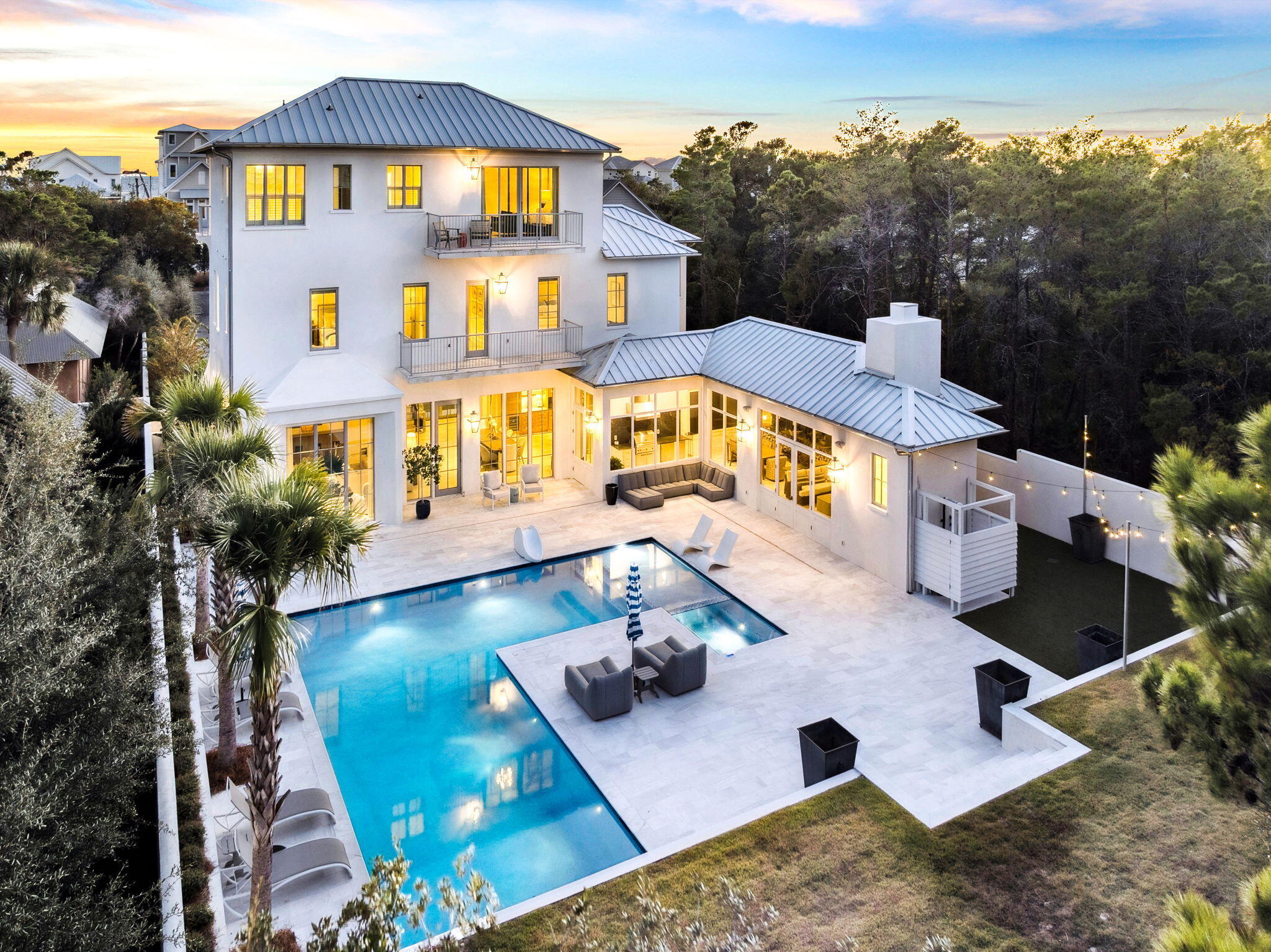 Situated in one of Inlet Beach's premier locations adjacent to Rosemary Beach, this newly constructed residence exemplifies sophisticated architecture and unmatched craftsmanship. Designed by Darrell Russell of A Boheme Design and built by Jared Smartt of Earthbuild Construction, the home spans three levels of refined living on a private, walled, and gated homesite.

Constructed to the highest standards, the property features solid concrete construction, a standing seam Galvalume roof, clad impact-rated windows and doors, and coastal-grade gutter systems engineered for durability and minimal maintenance. The climate-controlled two-car garage offers 14.5-foot ceilings, providing ideal clearance for a future vehicle lift. Inside, Diana Royale marble flooring anchors the primary living spaces, complemented by Venetian plaster walls, a groin-vaulted foyer ceiling, and exposed beam details. The expansive great room serves as the heart of the home, flowing seamlessly to the dining area, chef's kitchen, and outdoor living spaces. Just off the great room, a private loungethoughtfully designed as an intimate bourbon roomprovides a refined retreat tailored to the sophisticated gentleman of the family.

The chef's kitchen showcases Borghini marble surfaces and is equipped with a 48-inch Wolf dual-fuel range, Sub-Zero refrigeration columns, and a built-in Miele coffee system.

The owner's retreat occupies its own private levelan exclusive sanctuary offering Gulf of Mexico views, a luxurious bath clad in Calacatta Gold marble, and a fully customized closet system.

The second level features three beautifully appointed guest suites, a dedicated bunk suite, and an additional living space ideal for family gatherings, children's activities, or private media use. Completing the home's exceptional livability, there are three dedicated laundry areas strategically placed throughout the property for ultimate convenience.

The outdoor living experience is equally impressive, featuring a covered lounge with fireplace and a full outdoor kitchen for al fresco dining. The property boasts a large temperature-controlled saltwater pool and spaseldom matched in size anywhere along the market. Beautiful landscaping and curated lighting create a resort-like ambiance across the entire outdoor environment.

Set on one of the most expansive homesites on the east end of 30A, this gated compound offers rare opportunity for future expansion and development. The front portion of the property allows for the addition of a guest home, carriage house, or multiple garages, while the area beyond the pool can accommodate a pool house and/or a pickleball court.

Modern systems include whole-home audio-visual control, integrated security, Flo water monitoring, heat-detection sensors, and rooftop lightning protection. High-speed fiber internet infrastructure is currently being extended to the street.

With substantial square footage, concrete construction, and a secluded settingyet just steps from all that 30A offersthis residence is ideally suited for full-time living or as an exceptional seasonal retreat in one of Inlet Beach's most desirable enclaves.