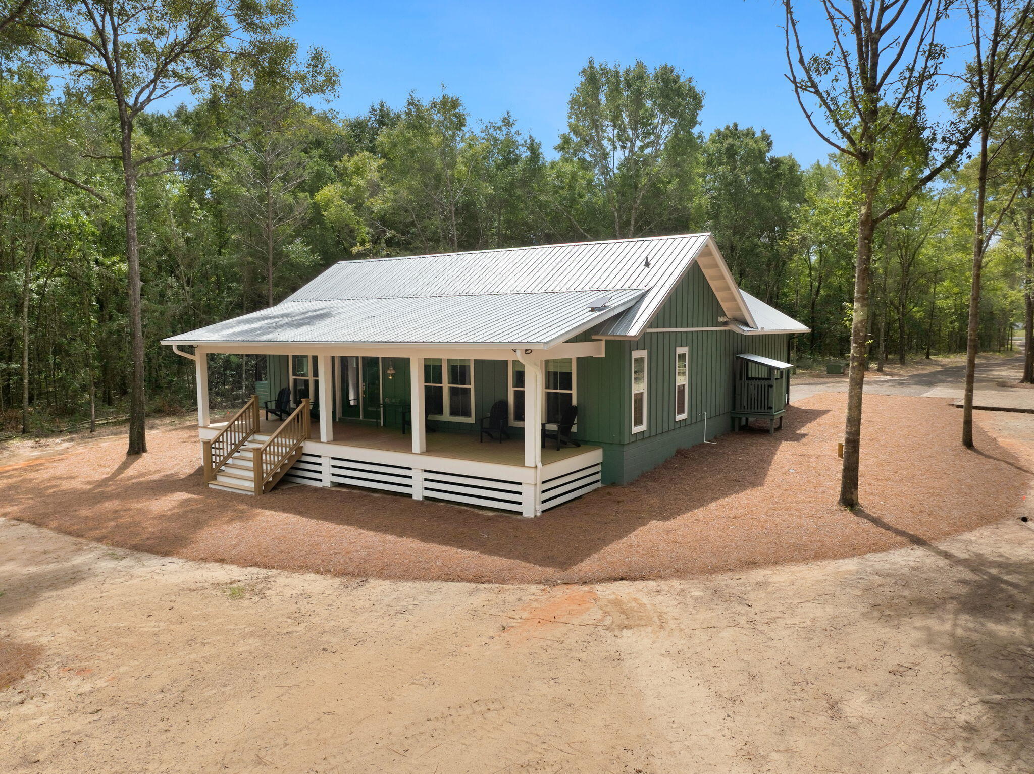 Primary residence, weekend lake cottage, or income producing short-term rental, 622 Martin Road is 30A build quality on private water with fishing off the back lawn. 

New construction lake cottage built by a 30A luxury builder, the home sits on a 2.45 acre lot with 133 feet of dockable lake frontage on Seacoast Lake in DeFuniak Springs, Florida. A metal roof, Hardie board and batten siding, foam insulation, flood zone X with no flood insurance required are just a few of the standout features. 

This 2 bedroom, 2 bathroom home provides homeowners and guests with a gated, private, spring fed lake out the back door, a second larger spring fed lake within the neighborhood, the springs about 20 minutes down the road and the 30A beaches of Blue Mountain and Grayton about 40 minutes south, quiet lake day and a beach day in one. Cast off your own shoreline in the morning in Seacoast Lake, then in the afternoon trailer over to Lake Holly, a 229 acre spring fed lake with a private boat launch to both lakes. 

Back at the house the porch is the space everyone will fight over. 400 square feet (40'x10') of lake view under a tongue and groove ceiling, framed on 2'x12' treated floor joists with 1'x6' treated deck boards. Behind it, large windows keep Seacoast Lake in the living space from first coffee to last light. Inside, a wood beam crosses the cathedral ceiling and engineered hardwoods run throughout. The kitchen pairs leathered luxury dolomite countertops with custom cabinets, open shelving, a walk-in pantry, a large stainless sink, and a gas range with four burners plus a griddle under a vent hood. Solid core doors, coastal trim, Roman shades, Delta plumbing fixtures and Emtek and Schlage hardware with backplates hold the finish level in every room. The primary suite offers a lake view, large walk-in closet and an en-suite bath with a curbless tile shower, while the guest bedroom includes a view of the lake, walk-in closet and sits beside a second full bath off the hall. A dedicated laundry room, attic storage, tankless gas water heater, and an oversized garage with nine foot doors, a 30 amp RV receptacle with water and sewer hookups complete it. 

Seacoast Estates ownership means access to two spring fed lakes, 43 acre Seacoast Lake and 229 acre Lake Holly, with Seacoast lake being gated and private to the neighborhood. Historic Downtown DeFuniak Springs and Lake DeFuniak are five miles away, Ponce de Leon Springs State Park, Morrison Springs and Vortex Spring roughly 20 minutes.