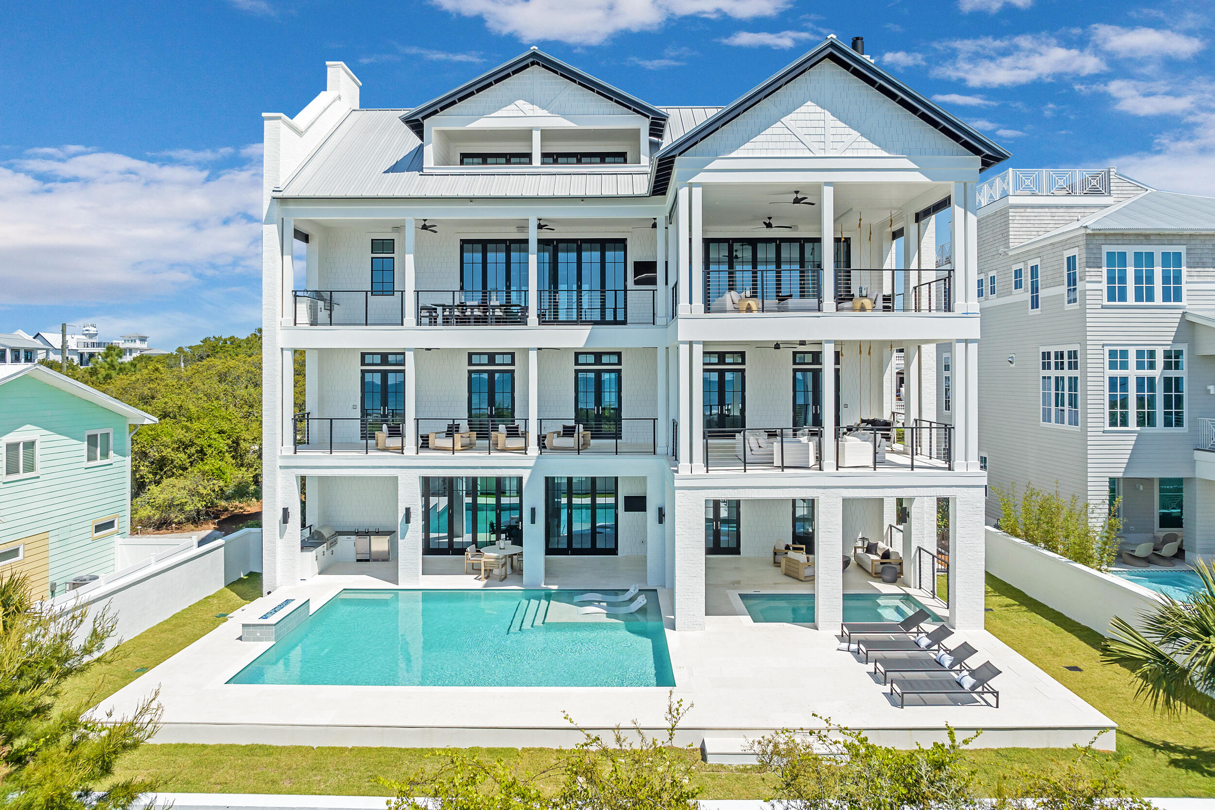 Some properties stand apart not because of any single feature, but because of how difficult their combination of features would be to replicate. This exceptional Inlet Beach residence offers more than 7,500 square feet of living space, over 4,200 square feet of covered porches and balconies, a resort-style private pool and spa, parking for at least eight full-sized vehicles, no HOA, Gulf views from multiple levels, and a location just moments from the beach and 30A.

Designed on a scale rarely found in a private coastal residence, the home spans four levels with multiple living and entertaining areas that allow large groups and multiple families to gather comfortably while still maintaining separation and privacy. At the heart of the property is an extraordinary outdoor environment featuring a 30' x 26' heated pool, 16' x 9' covered spa, outdoor kitchen, and expansive covered living areas that create the feel of a private resort.

The first floor is dedicated to poolside living and entertaining, with a spacious den, prep kitchen, pool-access bath, laundry room, and private guest suite opening directly to the covered spa and pool deck.

The second floor provides six bedrooms and six bathrooms, including four Gulf-view bedrooms with balcony access and two dedicated bunk rooms, creating substantial accommodations for family and guests. The third floor serves as the home's primary gathering space, with expansive open-concept living and dining areas, vaulted ceilings, gas fireplace, full wet bar, gourmet kitchen with butler's pantry, and direct access to covered outdoor living overlooking the Gulf.

The fourth floor adds another oversized bedroom, recreation room with built-in bunks, full bathroom, and covered balcony, providing a flexible private retreat for additional guests or extended family.

Beyond its size and amenities, the property offers something many luxury vacation homes can only project: demonstrated rental performance. In its first full year on the vacation rental market, the home generated more than $512,000 in 2026 gross rental revenue.

Whether envisioned as a private coastal retreat, a multigenerational gathering place, or a luxury property capable of generating substantial income when not in personal use, this is an opportunity defined by options. Exceptional scale, extraordinary outdoor amenities, no HOA, substantial parking, proximity to the Gulf and 30A, and proven rental performance come together in a property that would be extraordinarily difficult to duplicate.