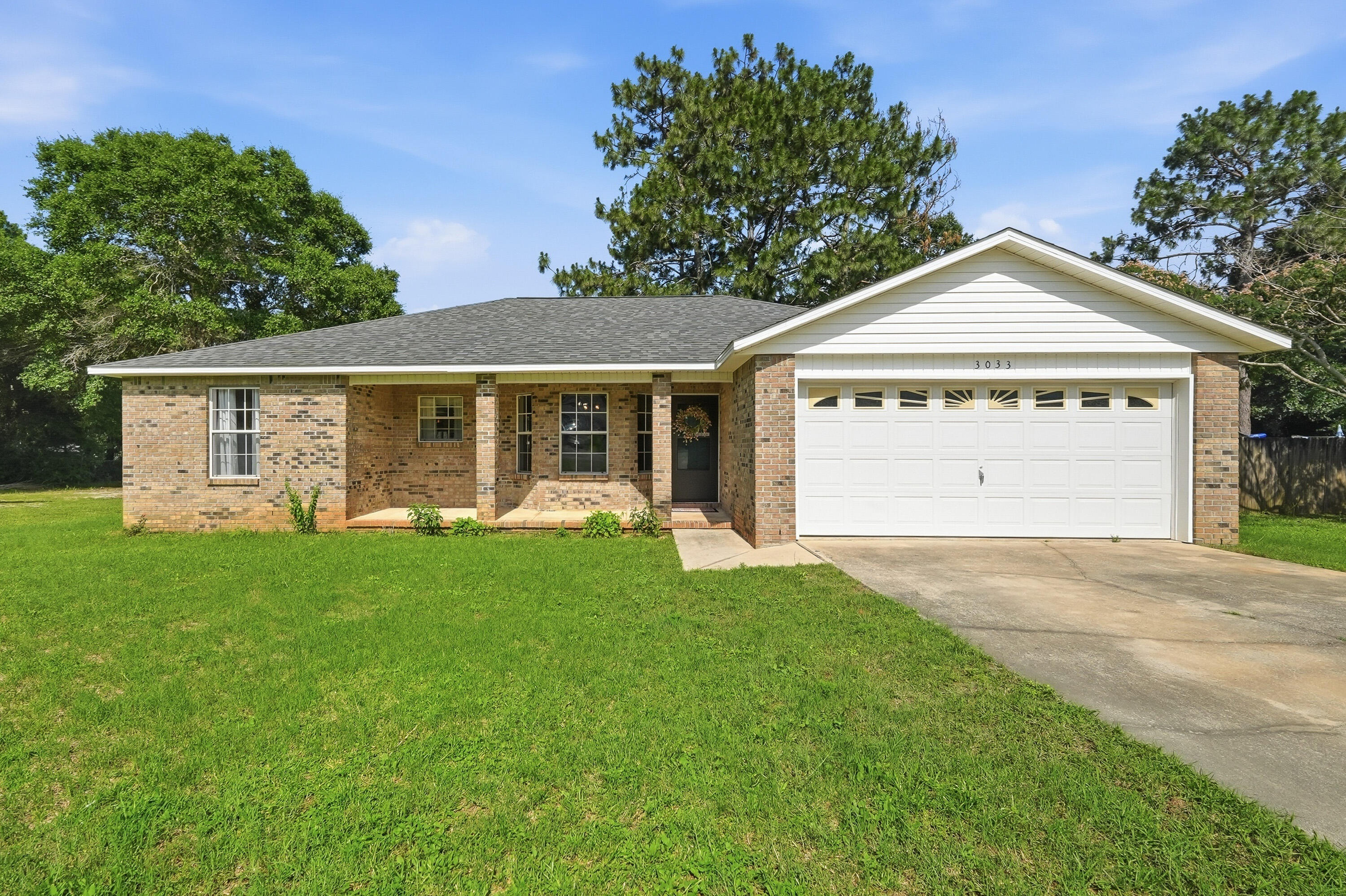 Tucked away at the end of a quiet cul-de-sac, this move-in-ready all brick home features a brand-new roof, brand-new water heater, and a 2019 HVAC system for added peace of mind. Inside, you'll find a spacious open-concept layout with cathedral ceilings in the living room, a tray ceiling in the primary suite, and a bright dining area accented by a bay window. The kitchen offers stainless  appliances, a breakfast bar, and stylish two-tone cabinetry. A laundry room with built-in shelving provides additional storage space. Thoughtfully selected designer paint colors throughout add character and personality while creating a warm, inviting atmosphere. Step outside to enjoy the fully fenced backyard featuring a large play fort with swings and slides. A rear deck provides the perfect spot for outdoor relaxation and entertaining. Conveniently located near shopping, schools, and everyday amenities.