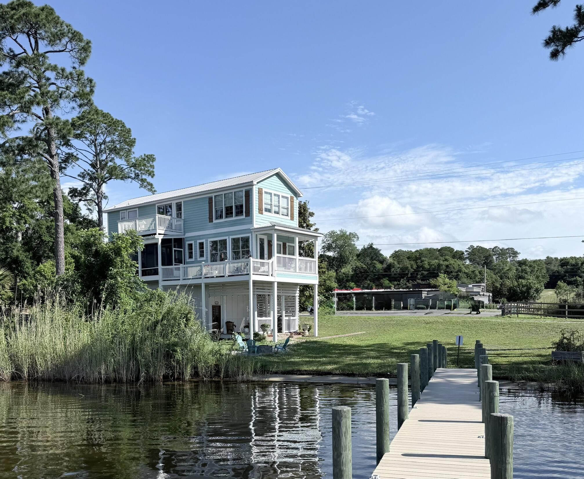 Deep Water Waterfront Home with 156' of shoreline along Boggy Bayou and Mill Creek where you can enjoy a front row seat to annual 4th of July Fireworks, and 364 other waterfont sunsets and recreation.
Only the guest bathroom does not have a direct facing window view of the water.
Waterfront views are unmatched, as is the convenient location. Top rated high, middle and elementary schools are all close-by.
First floor features a large garage and large separate storage room. Second floor includes kitchen, guest room and bathroom, and main living area. Off the second floor is a large screened in porch and 2 decks, one with a porch swing, all of which front the expansive waterfront.
Third floor includes the master bedroom and bathroom with walk-in shower (and yet another expansive view of the water), walk-in closet, laundry room, and yet another deck. Also on the 3rd floor is a 3rd bedroom and closet that serves the current owner as a TV Room with windows on 3 sides and affording additional unique views of the water. Outside, enjoy a deep water 2-level dock, boat lift covered by a metal roof, and adjacent fire pit.