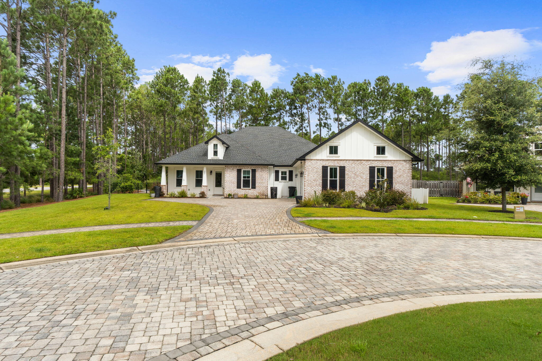 Experience exceptional craftsmanship and luxury living at **23 Vintage Cove**, a stunning Craftsman-style residence nestled within the prestigious master-planned community of **Hammock Bay**. One of only **four homes built by the custom builder Coastal Designs**, this exceptional property offers a rare combination of timeless architecture, premium finishes throughout.

From the moment you arrive, the home's charming curb appeal and beautifully landscaped grounds set the stage for what awaits inside. Luxury vinyl plank flooring flows throughout the open-concept living spaces, creating a warm and sophisticated atmosphere designed for both everyday living and effortless entertaining.

At the heart of the home is a chef-inspired gourmet kitchen featuring elegant **Statuary Classique quartz countertops**, sleek black stainless steel appliances, custom cabinetry, and an expansive island that invites family and friends to gather. The adjoining living room showcases a striking exposed brick archway and a cozy gas fireplace, creating the perfect setting for relaxing evenings or memorable celebrations.

The private primary suite is a true retreat, highlighted by impressive tray ceilings and a spa-inspired ensuite bath appointed with beautiful **Cotton White quartz countertops** and designer finishes that offer comfort and tranquility. Step outside into your own private oasis. The screened lanai overlooks a **heated inground swimming pool**, while the fully fenced backyard backs to a peaceful wooded preserve, providing exceptional privacy and a picturesque natural setting. Whether enjoying your morning coffee, entertaining guests, or unwinding under the stars, this outdoor space was designed to be enjoyed year-round.

Extensive upgrades totaling more than **$110,000** include:

* Heated inground pool
* Screened lanai and expanded patio
* Privacy fence
* Whole-home generator
* Attic lift
* Professional landscaping
* Luxury vinyl plank flooring
* Quartz countertops
* Storage building
* And numerous additional custom enhancements throughout the home

Located in the highly sought-after **Hammock Bay** community, residents enjoy resort-style amenities including swimming pools, fitness center, sports courts, walking and biking trails, parks, community events, and convenient access to the beaches of the Emerald Coast, Choctawhatchee Bay, and the area's premier dining and shopping destinations.

**23 Vintage Cove is more than a home--it's a rare opportunity to own a custom-built masterpiece where luxury, privacy, and an exceptional Florida lifestyle come together. Welcome home.**