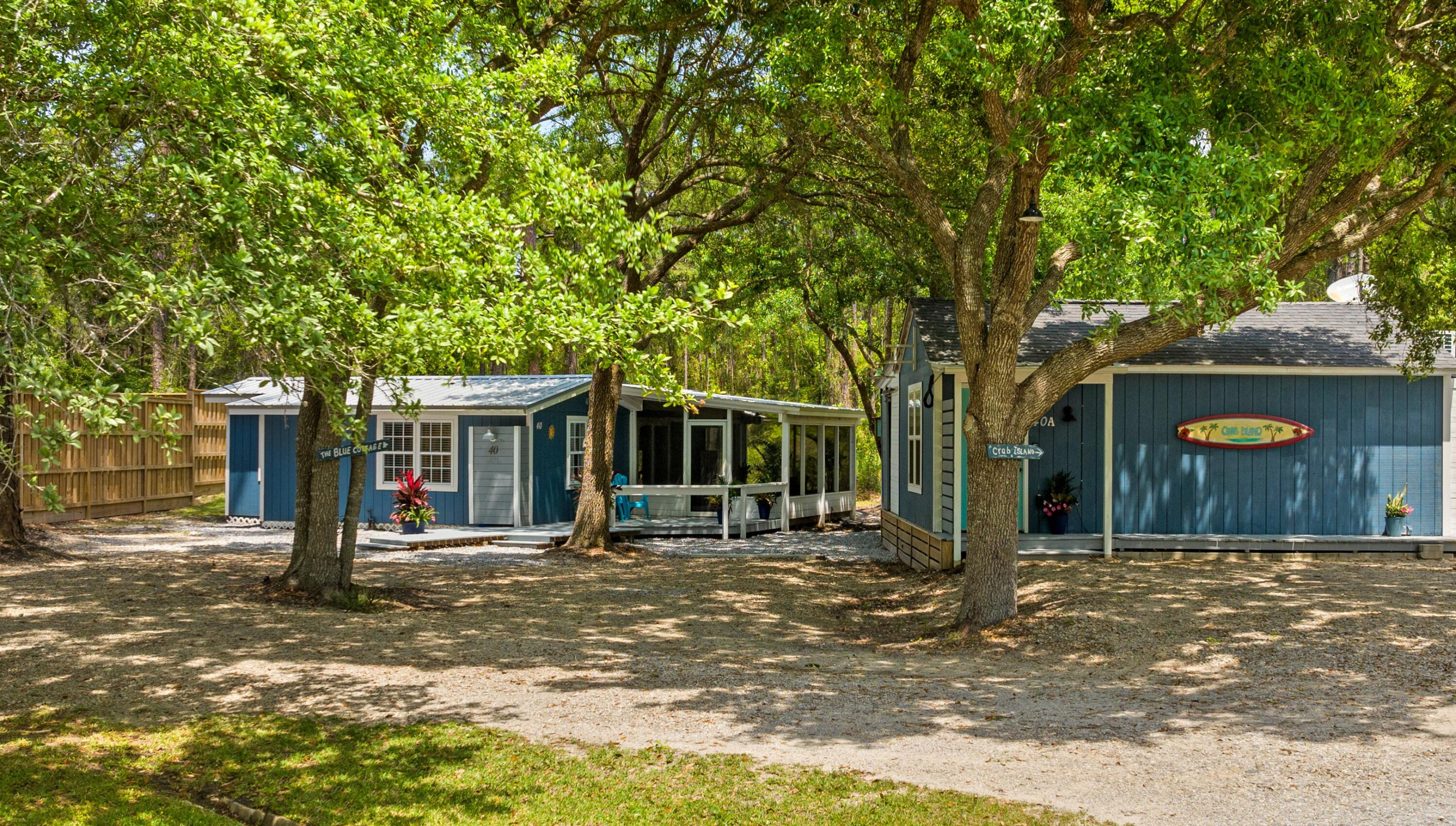 INVESTORS, PRIMARY RESIDENTS & MULTI-GENERATIONAL BUYERS--Discover an exceptional opportunity to own one of Santa Rosa Beach's most versatile properties-2 HOMES for the price of ONE! Just minutes from the sugar-white beaches of South Walton and Scenic Highway 30A, this unique coastal compound is zoned for both short-term and long-term rentals, offering incredible flexibility for investors, owner-occupants, workforce housing, or multi-generational living.

Situated on a 0.28-acre lot and bordered by a 255-acre conservation buffer that will never be developed, the property features two fully furnished coastal cottages, a 30-amp RV hookup with sewer connection, ample parking, no HOA, and room to add a pool, spa, garden, or expanded outdoor living spaces.

One of the property's most remarkable qualities is how it lives far larger than its square footage suggests. Expansive screened porches, generous decks, and thoughtfully designed outdoor spaces blur the line between indoors and out, creating an inviting coastal atmosphere where every square foot is maximized. Whether enjoying your morning coffee on the porch, entertaining friends outdoors, or unwinding after a day at the beach, the seamless indoor-outdoor flow becomes an extension of the living space.

The Blue Cottage offers 2 bedrooms, 1 bathroom, 868 square feet of heated and cooled living space plus a 178-square-foot screened porch, totaling 1,046 square feet of usable space. Extensive improvements include a 2023 metal roof, new kitchen appliances, new kitchen island, countertops, flooring, interior and exterior paint, water heater, washer and dryer, and a new laundry room door. The screened porch features a flat-screen TV and opens to a grilling deck, while plumbing is already in place for a future outdoor shower, pool, or spa. The most recent long-term lease generated $2,125 per month, while the cottage produced approximately $29,000 in gross short-term rental income during 2023.

Privately tucked away on the opposite side of the property, the detached "Crab Island" Studio Cottage, built in 2014, creates its own secluded retreat behind an 8-foot privacy fence. Perfect for pets, guests, or future outdoor enhancements, the fenced yard offers ample room for a pool, hot tub, or additional entertaining space. The studio features 350 square feet of interior living space complemented by an impressive 236-square-foot screened porch, where large sliding glass doors create a true indoor-outdoor living experience. Designed for coastal entertaining, the porch includes an outdoor kitchen with a wet bar, sink, mini refrigerator, storage, and ceiling fans, while the wraparound deck and outdoor shower make beach days effortless. Inside, the studio offers a kitchenette, an updated bathroom with a new shower, and flexible living space ideal as a guest house, artist's studio, home office, hobby room, fitness room, private retreat, or mother-in-law suite. The most recent long-term lease generated $1,675 per month, and the studio produced approximately $19,000 in gross short-term rental income during 2023.

With combined long-term rental income of $3,800 per month ($45,600 annually), this property offers outstanding flexibility. Live in one cottage while renting the other, lease both for investment income, accommodate extended family, create workforce housing for local professionals, or simply enjoy a private coastal retreat with supplemental rental potential.

Conveniently located just minutes from Scenic Highway 30A, Grand Boulevard, Topsail Hill Preserve State Park, Sacred Heart Hospital, shopping, dining, entertainment, and South Walton's world-famous beaches, this property combines privacy, versatility, and established income potential in one exceptional offering.

More than just two cottages, this is a thoughtfully designed coastal compound where lifestyle, flexibility, and investment opportunity come together--offering possibilities that are increasingly rare to find in Santa Rosa Beach.