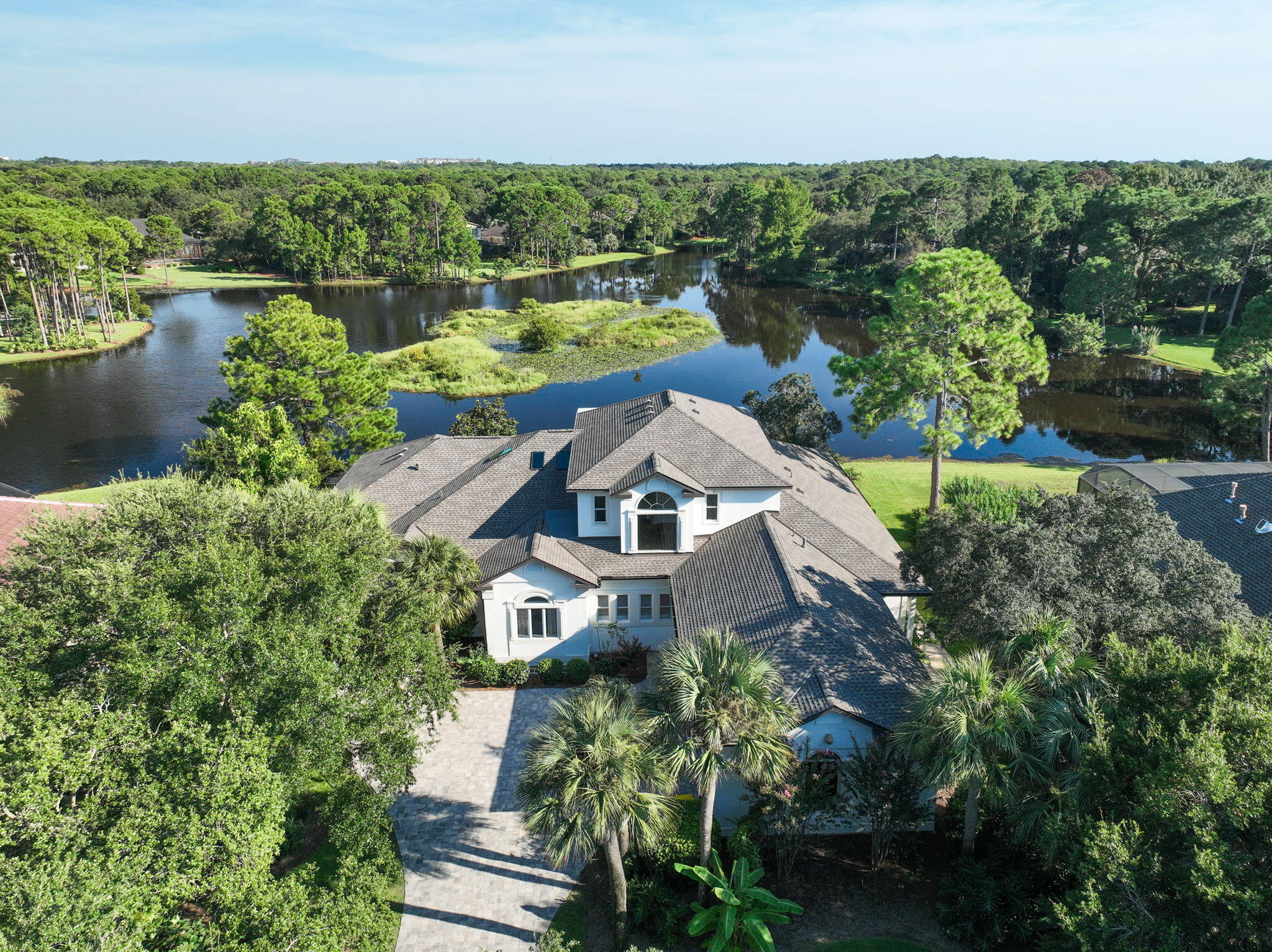 Remodeled Waterfront House with Private Pool, Mother-in-Law Suite & Expansive Living Spaces + NEW ROOF!

Welcome to a rare jewel in Destin's most coveted privately gated community -- Kelly Plantation. This exquisitely reimagined 5-bedroom, 4.5-bath + bonus room is a lakefront estate that showcases over 5,100+ square feet of refined living space, masterfully blending modern sophistication with timeless elegance. Completely remodeled to the highest standards, the home offers an open-concept layout designed to maximize natural light, flow, and breathtaking waterfront living from nearly every room. The living room, dining room, and sitting room feature a cozy fireplace and stunning luxury vinyl plank flooring and stunning cathedral ceilings that flows seamlessly throughout the home. Step into a one-of-a-kind, designer-crafted kitchen where timeless elegance meets artisan craftsmanship - all framed by stunning, panoramic lake views that pour in through oversized windows, bathing the space in natural light and serenity.

At the heart of this extraordinary kitchen is an expansive display of Taj Mahal Quartzite - a breathtaking natural stone featuring a soft white backdrop laced with delicate golden inlay. More durable than granite and celebrated for its marble-like, wispy drama, this quartzite crowns the countertops and a grand central island, making an unforgettable statement of refined luxury.

Encircling this masterpiece is a collection of storybook white cabinetry, custom-built with exquisite attention to detail. The cabinetry not only offers impeccable storage but also elevates the entire aesthetic, creating a bright, airy elegance that feels both elevated and inviting.

Adding warmth and artistic flair is a handmade, hand-laid pottery-style tile backsplash - each tile unique, each piece a testament to true craftsmanship. This artisanal element adds depth and texture, perfectly contrasting the sleek lines of the premium stainless-steel appliances and the deep, modern sink that completes the professional-grade functionality of the space.
Designed by a visionary and brought to life by a master craftsman, this kitchen is more than a culinary space - it's an inspired retreat, where luxury materials, thoughtful design, and uninterrupted lake views come together to create a truly unforgettable experience.

The 1st floor master suite is a tranquil retreat featuring elegant tray ceilings, private lanai and pool access, a spa-inspired en-suite bath, a soaking tub, Taylor-made tile shower w/ steamy glass, and a custom walk-in closet. A private mother-in-law suite is thoughtfully located on the first floor, featuring a separate entrance, full kitchen, living room with a cozy fireplace, a spacious bedroom, and a well-appointed private bath - perfect for multigenerational living or long-term guests.

The home boasts soaring 12-foot ceilings on the main level and a showstopping, fully enclosed lakefront pool and hot tub that redefine luxury outdoor living. Over $35,000 was meticulously invested into this private oasis, featuring a newly installed stained pine ceiling that exudes warmth and sophistication, a state-of-the-art breathable enclosure for year-round enjoyment, a redesigned deck, and an upgraded high-efficiency pool heater. Every detail was thoughtfully curated to create a seamless indoor-outdoor retreat, perfectly positioned on the lake - offering a level of elegance, privacy, and craftsmanship that is truly unmatched anywhere else.

Upstairs, you'll find two additional bedrooms, a stylish full bath, and a generous 2nd living area complete with a third kitchen, 10-foot ceilings, and separate washer/dryer hookups - a rare and highly versatile layout offering exceptional comfort and independence for guests...all while overlooking Lake Rangia and staring at an island from your bay windows.

Constructed with ICF (Insulated Concrete Form) technology for superior durability, energy efficiency, and noise reduction, this home also includes a three-car garage and extensive outdoor living areas designed for luxury lakeside living. The private lake behind the home is both filtered and stocked with fish, offering a serene and recreational backdrop.

Over $30,000 was invested in exquisite, custom Brazilian pavers that create a stunning first impression as they gracefully welcome you up the driveway, elegantly encircle the home, 3 car garage, and continue down to the poolside and serene lakeside steps - blending luxury, craftsmanship, and timeless curb appeal.

As a resident of Kelly Plantation, you'll enjoy an unrivaled lifestyle with access to world-class community amenities, including:

An owners' clubhouse

A state-of-the-art fitness center with yoga studio

Tennis and pickleball courts

Basketball and beach volleyball courts

Riding stables, community docks, playgrounds, and scenic walking trails, + so much more!

Set amidst the lush, storied landscape of a former turpentine plantation, Kelly Plantation is also home to the iconic golf course designed by Fred Couples and Gene Bates -a championship course winding through tranquil bayous, waterfront vistas, and towering pines.

This move-in ready masterpiece is the perfect blend of luxury, functionality, and privacy in one of Destin's most desirable addresses.

Experience the pinnacle of coastal living - welcome home to Kelly Plantation.