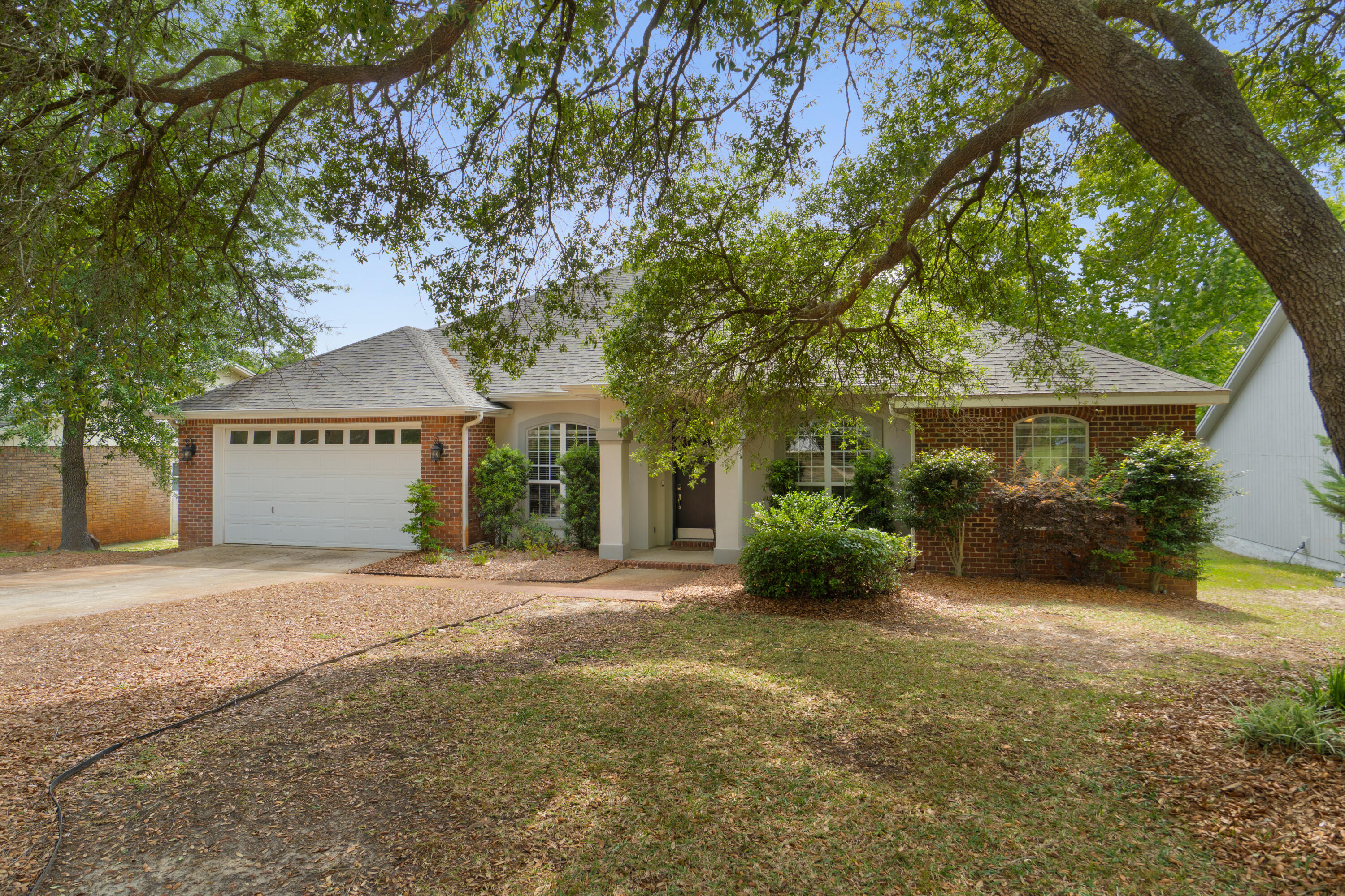 This 2006 home lives large with 4 bedrooms plus an formal dining, lake views, and a massive 30 foot screened back porch! Stepping through the foyer the living space greets you with tray ceilings, recessed lighting, and a gas fireplace. The split floor plan gives extra privacy for the primary suite, with an extra large walk in closet, double vanity, and jet tub. Updated systems with a 2024 HVAC, 2021 WH, a new gas range and stainless appliances. Additional luxuries include a whole house water treatment system, back deck, and crown molding in all main areas and all bedrooms. The location is excellent with quick access to Destin and Eglin AFB, with the ever present breeze overlooking the lake!