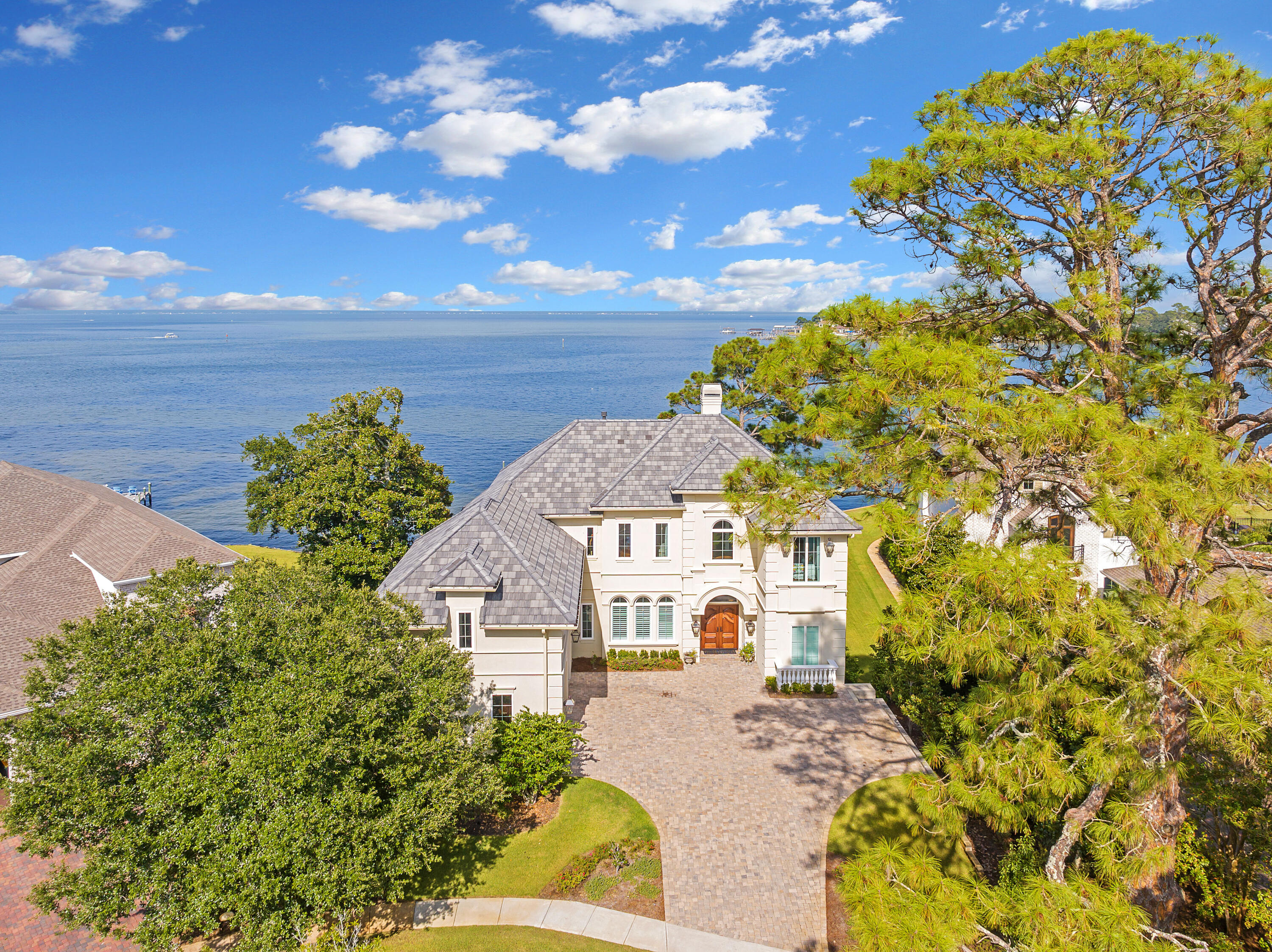 Imagine, a European styled home nestled in the heart of Destin, Florida. A true hidden gem on the Emerald Coast, the LeTourneau custom built home at 919 Peacock's Point Drive. This unique home offers an unparalleled blend of luxury and serenity. Spanning an impressive 5000 square feet, this exquisite property features 5 lavish bedrooms and 5.5 opulent bathrooms, each designed with the finest finishes & attention to detail. This gem also includes 3 fireplaces, an art room, men's trophy room, a quaint office, all with an over abundance of storage.

From the moment you enter, the marble foyer welcomes you with soaring 12 foot ceilings and breathtaking Bayfront views of the crystal-clear waters that border your private retreat. The main living area is a masterpiece of design featuring elegant details. The home ensures that every corner is bathed in natural light and offers sweeping views of the surrounding waterscape which includes 120 feet located on the prestigious Joe's Bayou.

Step outside to your expansive terrace, where you can bask by the salt water pool in the Florida sunshine or dine al fresco while watching the sunset over the water. The property includes a private dock, perfect for your water toys or enjoying a quiet morning of fishing.

The gourmet chef's kitchen is equipped with top-of-the-line appliances, custom cabinetry, and luxurious quartzite countertops, making it ideal for both cooking and entertaining.
Located in an exclusive gated 6 home enclave known for it's privacy and prestige, 919 Peacock's Point Drive is not just a home; it's a lifestyle choice for those who demand the very best in the heart of the Emerald Coast, Destin, Fl.