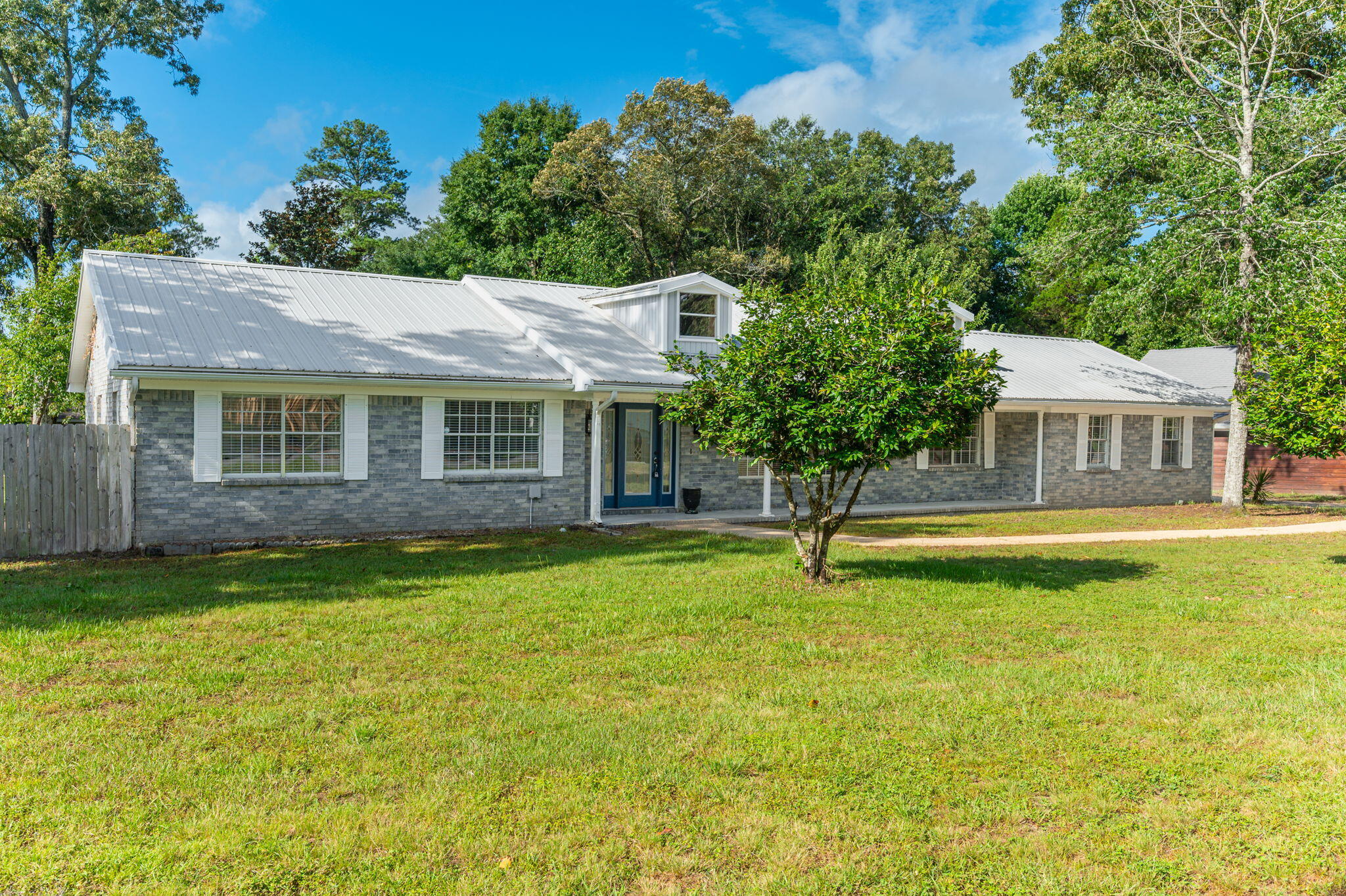Situated on a beautiful half-acre lot, this spacious 4-bedroom, 3-bath home offers over 2,600 square feet of thoughtfully designed living space with a split floor plan that provides both comfort and privacy.

On the opposite side of the home, three additional bedrooms provide ample space for family and guests, including one bedroom with its own private ensuite bathroom and walk-in shower. A third full bathroom conveniently located in the hallway helps accommodate busy mornings and visiting guests with ease.

Major updates have already been taken care of, including a gas water heater installed in 2024 and a new HVAC system in 2025. The metal roof is believed to have been installed in 2015, providing long-term durability and peace of mind.  Seller will replace roof with new architectural shingles prior to closing with acceptable offer. Solar panels will be removed. 

Combining generous living space, an ideal layout, and valuable upgrades, this property offers a wonderful opportunity to enjoy comfortable living both inside and out.